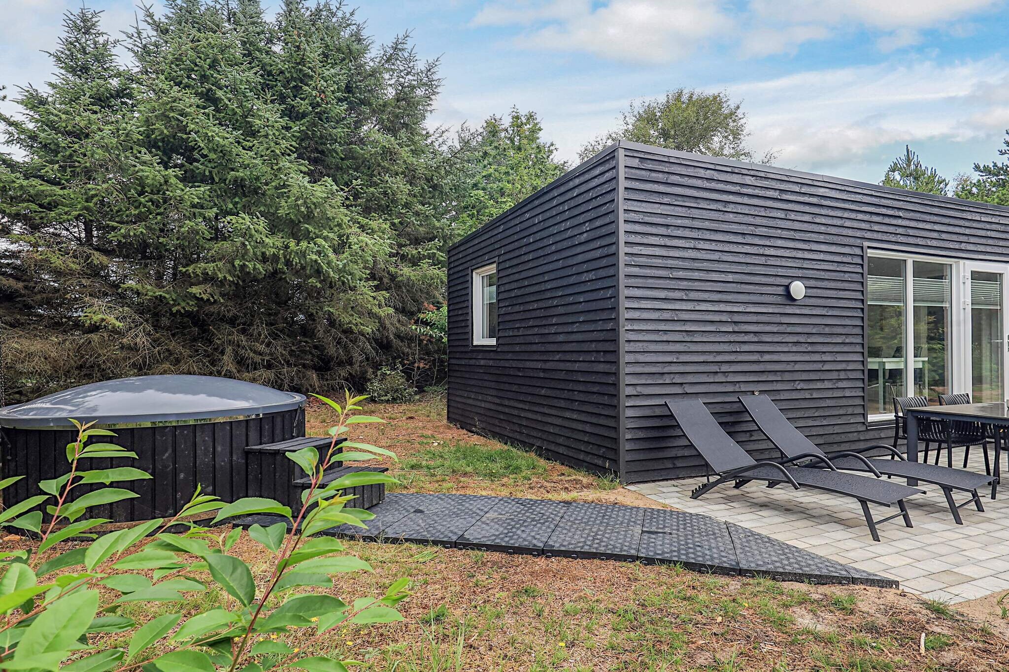 Kitchen(stove(induction), cooker(electric), cooker(2 ring stoves), coffee machine, oven, dishwasher, fridge), Living/bed room(TV), bedroom(2x double bed), bedroom(bunk bed), bathroom(washbasin, shower, shower(outside), toilet), heating(electric), terrace, parking