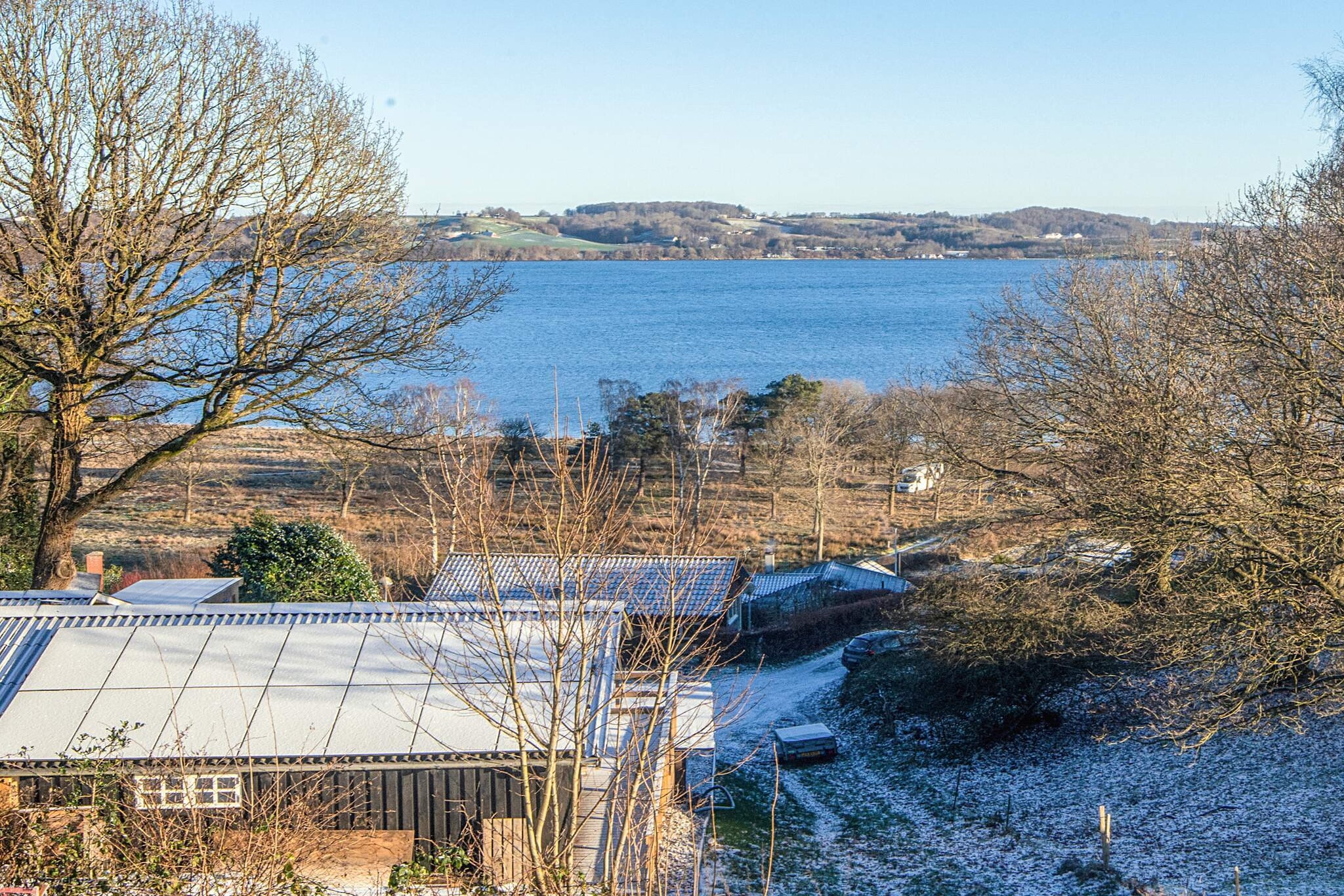 This charming summer house is set on a hilly plot of 691 m² with a panoramic view of the water, just 300 meters from the coast, ideal for fishing and swimming. The property accommodates six guests and features an outdoor sauna, covered terrace, and garden furniture for relaxing and enjoying the views. A separate annex provides additional sleeping space. Inside, there is one bedroom with a double bed and cot, a family room with a double bed, TV, and high chair, and an annex with a double bed. The kitchen is fully equipped with an electric stove, refrigerator with freezer, coffee maker, and dishwasher. The bathroom has a shower, WC, sink, washing machine, and tumble dryer. Additional amenities include electric heating, air/air heat pump, and play equipment for children. The house was originally built in 1961 and renovated in 2025, offering a modern, comfortable interior while retaining a cozy charm. Outdoor features include a charcoal grill, terrace, and shower for convenient outdoor living. The location is perfect for exploring East Jutland, with its lush landscapes, forests, and family-friendly beaches along the Kattegat coast and in the fjords. Nearby towns include Aarhus, Denmark’s second-largest city, with cultural attractions such as the Aros Art Museum and Den Gamle By, as well as festivals like Aarhus Festuge. The towns of Horsens and Skanderborg are also within reach, offering music festivals, museums, and local charm.A refundable deposit might be charged closer to your check-in date. The security deposit ensures a smooth stay and covers any additional services or consumption charges.This deposit covers utilities consumed during your stay and any additional services that may be taken.The final amount will be adjusted based on actual meter readings, actual usage of extra services, and any remaining balance will be refunded within 21 days after checkout.This deposit simply acts as a prepayment for charges that  you would anyways pay for, ensuring a seamless stay and check-out experience.