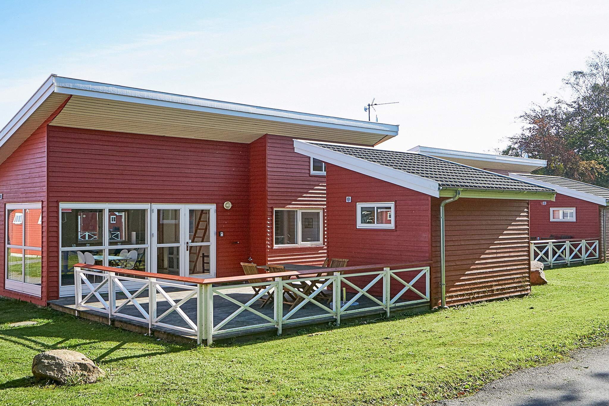 Holiday Homes by One of Denmark’s Most Beautiful Golf Courses Welcome to Rø Golfhuse, a peaceful holiday park set in the heart of Bornholm’s scenic countryside, right beside the famous Rø Golf Courses. Surrounded by rolling green landscapes, forests, and open skies, this charming holiday park offers the perfect blend of tranquillity, comfort, and outdoor living. Whether you’re a golf enthusiast, a nature lover, or simply seeking a relaxing escape, Rø Golfhuse is an idyllic base for experiencing the beauty of Bornholm. Designed in a bright, modern Scandinavian style, the holiday homes are filled with natural light and a calm, welcoming atmosphere that immediately makes you feel at ease. The Accommodation The holiday homes at Rø Golfhuse are modern, well-appointed, and thoughtfully designed for 2 to 6 guests, making them ideal for couples, families, and small groups. Each home offers:  A bright living room with large windows and a flat-screen TV A compact, fully equipped kitchen with dishwasher and modern appliances A bathroom with underfloor heating for year-round comfort Fibre broadband for work, streaming, and staying connected  Outside, a large private terrace with garden furniture invites you to enjoy the sun for most of the day while overlooking the quiet holiday area perfect for relaxed breakfasts, long lunches, and peaceful evenings. Some houses also have a separate 10 m² annex with two beds, providing extra privacy and flexibility. This layout is ideal if you are travelling with older children, friends or grandparents. A small outbuilding provides additional convenience with secure storage for bicycles, golf and outdoor equipment. The layout of the houses balances shared living spaces with private sleeping areas, making them especially well suited for multigenerational holidays or group stays where comfort and space are essential.A refundable deposit might be charged closer to your check-in date. The security deposit ensures a smooth stay and covers any additional services or consumption charges.This deposit covers utilities consumed during your stay and any additional services that may be taken.The final amount will be adjusted based on actual meter readings, actual usage of extra services, and any remaining balance will be refunded within 21 days after checkout.This deposit simply acts as a prepayment for charges that  you would anyways pay for, ensuring a seamless stay and check-out experience.