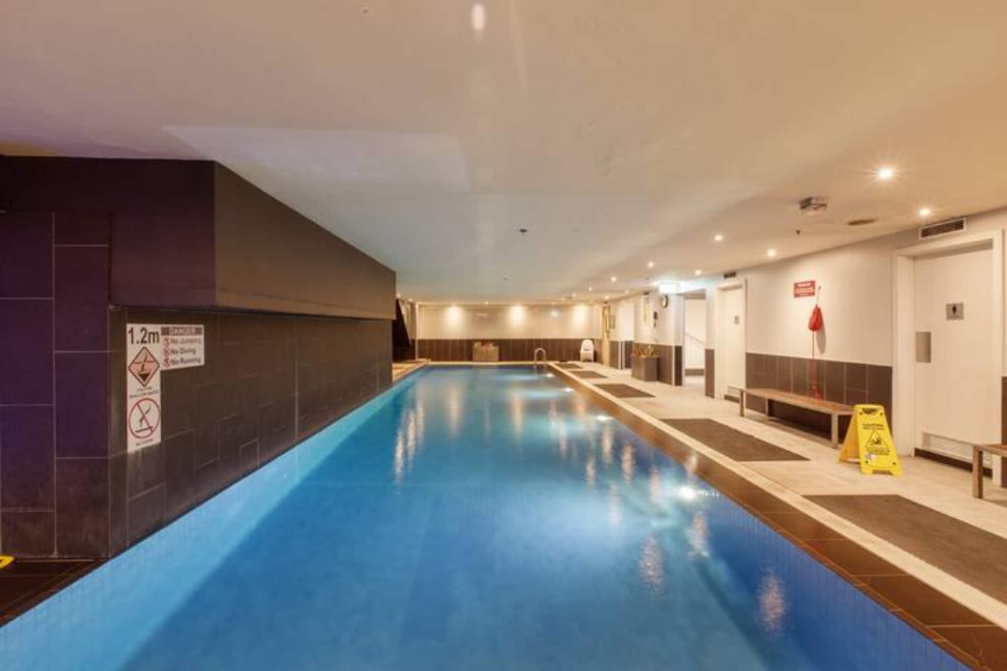 Perched above the Melbourne CBD, this spectacular apartment has panoramic vistas of the city skyline and river through gallery windows. It’s beautifully styled with plush bedding in two bedrooms, an executive kitchen and formal dining. The living room has wraparound windows, chic lounges and modern entertainment. You also have access to a communal gym, sauna and indoor pool and Jacuzzi. Melbourne’s inner-city sights, laneways, restaurants, galleries, theatres and bars are all right outside.
The space
This executive apartment is set across two levels with large windows overlooking the Melbourne CBD and Yarra River. It has sleek timber flooring and finishes throughout, along with designer furnishings and high-end appliances.
 
General
- Entire two-bedroom, one-bathroom apartment
- City and river views
- Air conditioning
- Laundry facilities
- Wi-Fi
- Communal pool, Jacuzzi, sauna and gym
 
Living room
- Flat-screen TV
- Sofa
- Dining table
- Air conditioning
 
Bedrooms and bathrooms
- Bedroom 1: Queen-size bed, blinds, built-in wardrobe, air conditioning, open plan living, no bedroom door available
- Bedroom 2: Queen-size bed, blinds, built-in wardrobe, air conditioning
- Bathroom with hairdryer
- Top quality linens & towels
 
Kitchen
- Stainless-steel appliances
- Electric oven and gas stovetop with rangehood
- Toaster, microwave, coffee machine and kettle
- Fridge and freezer
- Dishwasher
 
Laundry
- Iron and ironing board
- Washing machine and dryer
- Clothes drying rack
 
Points of Interest
- SEA LIFE Melbourne Aquarium 0.5 Km, seven-minutes walk or five-minutes drive
-.Federation Square 1.0 Km, 12-minutes walk or five-minutes drive
- Immigration Museum 0.2 Km, three-minutes walk or one-minutes drive
 
Beach Access
- Port Melbourne Beach 4.6 Km, 12-minutes drive
- St Kilda Beach 6.8 Km, 16-minutes drive
 
Airport Access
- Melbourne Airport 23.3 Km, 23-minutes drive
- Avalon Airport 55.0 Km, 46-minutes drive
Local area description
The Melbourne CBD is a hub of cosmopolitan entertainment, dining and shopping. Melbourne’s rich history shines through its Heritage-listed buildings and the city’s modern culture is felt within its chic eateries, sprawling food halls, art-house films and international fashion retailers. Federation Square showcases the visual arts and hosts community events, while Chinatown Melbourne and laneway cafes keep the foodie scene diverse.
House rules
You are staying in a friendly and peaceful neighbourhood and we kindly ask you to respect the community and your surrounding neighbours. The following strict House Rules apply:
 
- No loud noise between 10 pm and 8 am
- No parties or antisocial behaviour
- No additional people are to access the property without our prior approval
- No pets are allowed in the property without approval
- No smoking is allowed at any times
- If you break something, please let us know
 
- To help protect all floor coverings do not wear any shoes inside the property
 
 
Please be aware that excessive noise such as amplified music, vocals or screaming or anti-social behaviour in the property or common areas can cause neighbours to complain to us, the Building Manager, Council Rangers or Police.
 
 
IMPORTANT: Any breach of the House Rules may lead to a $500 fine plus compensation for any cost/damage created and immediate eviction of the property.
 
 
Finally, when checking out, we kindly ask you for the following:
 
- Please leave all beds unmade
- Please clean up your dishes and put them away
- In case you have rearranged furniture, please put it back to the original location
- Please take out the rubbish and remember to use the right bins
- Please ensure all appliances, A/C and lights are off and doors and windows are closed
Interaction with guests
Welcome to MadeComfy! Our local team curates stays in exceptional Australian & New Zealand properties, ensuring style, comfort, and prime locations for discerning guests. We prioritise your needs to provide a memorable home-away-from-home experience. Explore our digital guidebooks for local recommendations, and don't hesitate to contact us throughout your stay. We're here to ensure your comfort – enjoy your stay with MadeComfy.
Notes
For your comfort, this property is prepared with professional-grade hotel-style linen, including a three-sheet setup, ensuring a fresh and hygienic sleep experience.
 
Extra Services:
- Early check-in: Our standard check-in is at 3 pm. To guarantee early access to the property we suggest booking the night before if available. Otherwise, early check-in is subject to availability from the night before at an additional cost.
- Late check-out: Our standard check-out is at 10 am. To guarantee a later check-out of the property we suggest booking an additional night if available. Otherwise, a late check-out is subject to availability from the night before to an additional cost.
- Baggage: For security reasons, we are unable to receive or to keep unattended baggage before check-in or after check-out
- We provide a small welcome amenity pack to get your stay started
 
Note
- No parking
- Access card from reception is required to access the complex facilities
- Go to the ground floor and take the lift to the basement level to access the gym and pool area
- Air conditioning in the living room and bedrooms
- Not suitable for kids - The main bedroom has nib walls that open to a void, dropping down to the level below.
- For safety and to avoid any potential damage, please ensure the scissor lift is fully lowered after each use.
In the past, vehicles have accidentally hit the lift when left raised, causing property damage and operational delays.
- CitiPower will be conducting essential underground cable upgrade works along Flinders Lane throughout August and September 2025. This may temporarily affect vehicle and pedestrian access near the property.
- This booking is protected with coverage for lost baggage and emergency medical expenses, provided by Travel Support with claim upto 500 AUD (T&C Applies). For more details reach out to Guest Support team post booking.
Access description
You’ll have access to the entire property when you stay here, so it will feel like your own home.
Getting around
We highly recommend using ride-sharing services.
 
Check out the TripGo app for transport timetables.
 
Public transport
The Market St/Flinders Lane tram stop is right outside the building and has regular lines servicing the Melbourne CBD. Flinders Street Railway Station is 650 metres away and has multiple trains accessing the inner and outer suburbs. There are also bus stops along Flinders Street.
 
Ride sharing
Ride sharing apps are a safe and easy way to get around, especially late at night when public transport services are less frequent. Prices are about two-thirds of a taxi, but may surge during bad weather or public events.
 
Points of Interest
- SEA LIFE Melbourne Aquarium 0.5 Km, seven-minutes walk or five-minutes drive
-.Federation Square 1.0 Km, 12-minutes walk or five-minutes drive
- Immigration Museum 0.2 Km, three-minutes walk or one-minutes drive
 
Beach Access
- Port Melbourne Beach 4.6 Km, 12-minutes drive
- St Kilda Beach 6.8 Km, 16-minutes drive
 
Airport Access
- Melbourne Airport 23.3 Km, 23-minutes drive
- Avalon Airport 55.0 Km, 46-minutes drive