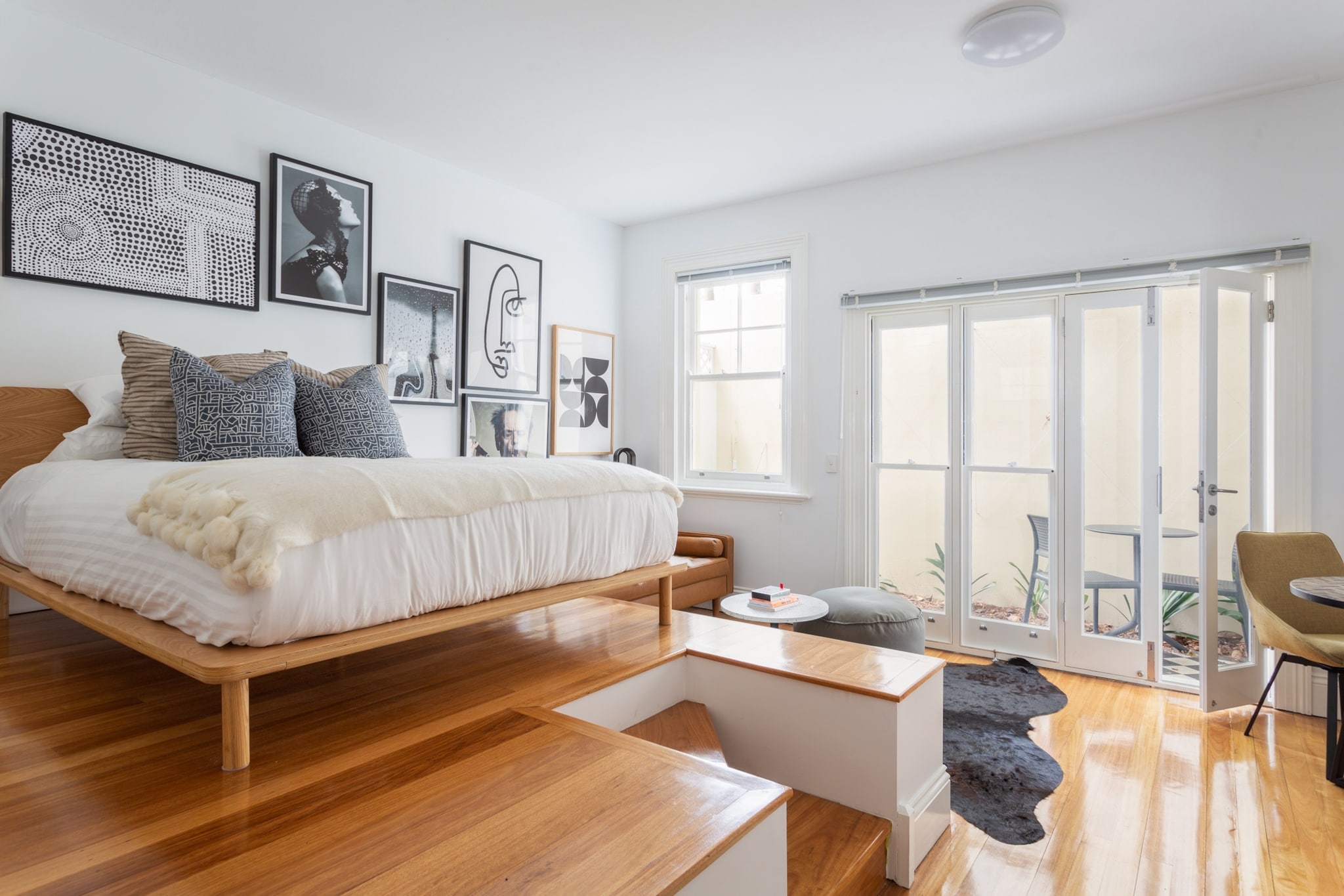 This stylish studio in a heritage-listed building is a great place to stay, whether you’re in Sydney for work or pleasure. You’ll be blown away by the grand entrance, with its bronze fountain, trimmed hedges and checkerboard tiles, then wowed even more by the designer touches in the studio itself. The walls are crammed with art, the furniture is elegant and there’s even a little courtyard. A real kitchen and access to common areas add to the experience. And the city is 25 minutes away.

The space
This first-floor studio has its own little courtyard with outdoor furniture, which provides natural light and fresh air. The floors are polished timber and the couch is a comfy leather two-seater. There’s a two-person dining setting inside as well, which doubles as a desk for visitors on business. There is one flights of stairs from street level to the property.
 
General
- Heritage touches including high ceilings and wooden floors
- Secure building with intercom access
- Private courtyard with outdoor furniture
- Contemporary furniture and artworks
- Washing machine and drying rack provided
- Portable heaters and fans provided
- Access to common area sitting room
- Wi-Fi is available
- Self check-in
 
Studio
- Queen bed and blackout curtains
- Flat-screen wall-mounted TV
- Sofa and two-person dining setting
- Opens onto courtyard
- Stylish bathroom with checkerboard tiles, shower and luxe toiletries
- Top quality linen and towels
 
Kitchen
- Electric cooktop
- Modern stainless-steel appliances
- Dishwasher
- Coffee machine
Local area description
Located in Sydney’s trendy Inner West, Lewisham is a relaxed residential suburb characterised by Victorian and Edwardian mansions, post-war apartments and quiet streets. Young families and older residents are attracted by its access to the Light Rail and Sydney Trains, as well as its convenient location near the city and the airport. It’s also close to some great dining and entertainment areas, including New Canterbury Road, Norton St and Marrickville Road.
House rules
You are staying in a friendly and peaceful neighbourhood and we kindly ask you to respect the community and your surrounding neighbours. The following strict House Rules apply:
- No loud noise between 10 pm and 8 am
- No parties or antisocial behaviour
- No additional people are to access the property without our prior approval
- No pets are allowed in the property without approval
- No smoking is allowed at any times
- If you break something, please let us know
 
- To help protect all floor coverings do not wear any shoes inside the property
 
Please be aware that excessive noise such as amplified music, vocals or screaming or anti-social behaviour in the property or common areas can cause neighbours to complain to us, the Building Manager, Council Rangers or Police.
 
IMPORTANT: Any breach of the House Rules may lead to a $500 fine plus compensation for any cost/damage created and immediate eviction of the property.
 
Finally, when checking out, we kindly ask you for the following:
- Please leave all beds unmade
- Please clean up your dishes and put them away
- In case you have rearranged furniture, please put it back to the original location
- Please take out the rubbish and remember to use the right bins
- Please ensure all appliances, A/C and lights are off and doors and windows are closed
Interaction with guests
Welcome to MadeComfy! Our local team curates stays in exceptional Australian & New Zealand properties, ensuring style, comfort, and prime locations for discerning guests. We prioritise your needs to provide a memorable home-away-from-home experience. Explore our digital guidebooks for local recommendations, and don't hesitate to contact us throughout your stay. We're here to ensure your comfort – enjoy your stay with MadeComfy.
Notes
For your comfort, this property is prepared with professional-grade hotel-style linen, including a three-sheet setup, ensuring a fresh and hygienic sleep experience.
 
Extra Services:
- Early check-in: Our standard check-in is at 3 pm. To guarantee early access to the property we suggest booking the night before if available. Otherwise, early check-in is subject to availability from the night before at an additional cost.
- Late check-out: Our standard check-out is at 10 am. To guarantee a later check-out of the property we suggest booking an additional night if available. Otherwise, a late check-out is subject to availability from the night before to an additional cost.
- Baggage: For security reasons, we are unable to receive or to keep unattended baggage before check-in or after check-out
- We provide a small welcome amenity pack to get your stay started
- This booking is protected with coverage for lost baggage and emergency medical expenses, provided by Travel Support with claim upto 500 AUD (T&C Applies). For more details reach out to Guest Support team post booking.
Access description
You’ll have access to the entire property when you stay here, so it will feel like your own home.
 
- The keys will be left in a lockbox onsite. We will send you the access code 3 days prior to your arrival.
Getting around
We highly recommend using ride-sharing services.
 
Check out the TripGo app for transport timetables.
 
Public transport
Lewisham Station is 10 minutes walk away. Trains to the city leave four times an hour and take 15 minutes. The light rail is even closer, providing access to the Inner West and Darling Harbour.
 
Ride sharing
Ride sharing apps are a safe and easy way to get around, especially later at night when public transport services are less frequent. Prices are about two-thirds that of taking a taxi, but may surge during bad weather or public events.
 
Points of Interest
- Norton St Restaurant Precinct, 3.5Km, five-minutes drive
- Central Business District 8.0Km, 13-minutes drive
- Darling Harbour 12.6Km, 18-minutes drive
 
Beach Access
- Bondi Beach 15.7Km, 27-minutes drive
 
Airport Access
- Kingsford Smith Airport 7.6Km, 15-minutes drive