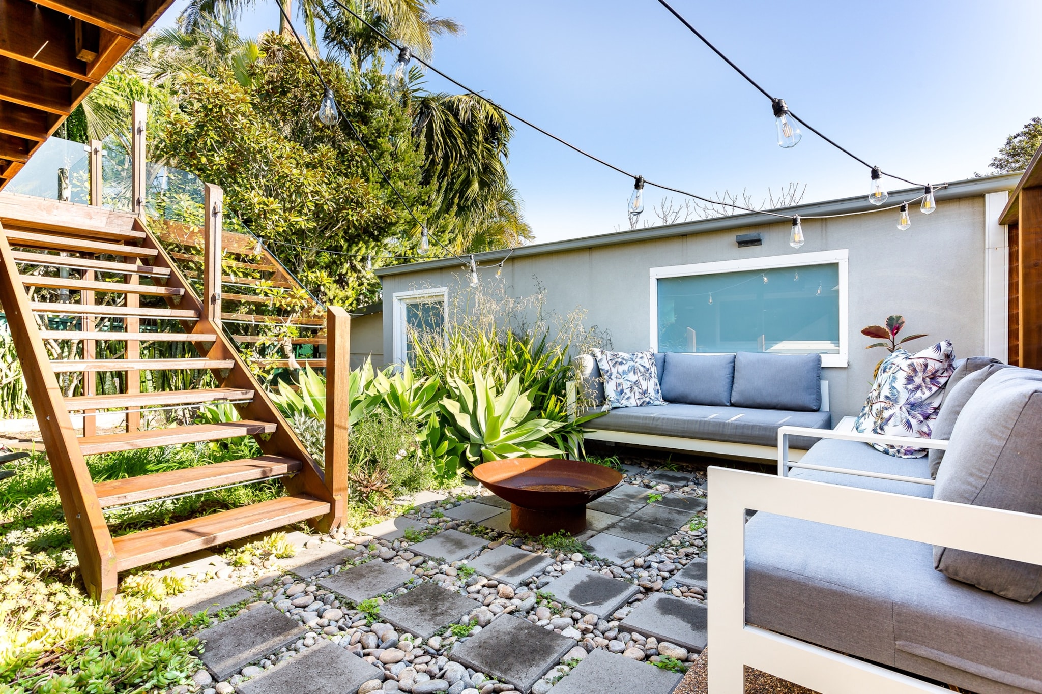 Property description
Experience the coastal atmosphere of Sydney in this idyllic 4-bed home with an elevated alfresco area near the popular Dee Why beach. With charming and homely interior decor this comfortable property features spacious outdoor areas with seating, dining, BBQ and fairy lights. Situated steps from the beach, rockpool, cafes and shops, the property offers an unbeatable location set back from the busy main streets. This property is perfect for those wanting a memorable getaway.

The space
Immaculately designed and furnished this elegantly elevated home offers a welcoming and homely property to settle into. Featuring spacious rooms, a sleek kitchen, modern appliances, chic bathrooms, comfortable living rooms and unmatched outdoor alfresco or lounge areas with seating, this property is perfect for those warm beachside holidays.