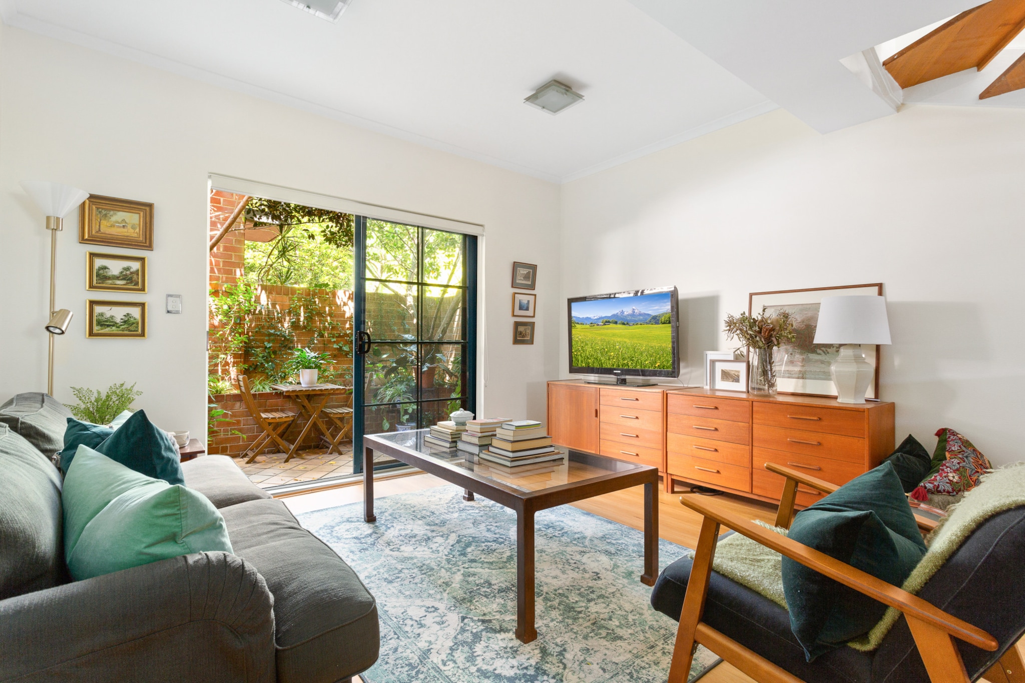 Experience Sydney’s vibrant atmosphere in this spacious 2-bed townhouse with a lush courtyard. Situated near the bustling Erskineville Road shopping strip and train station, the property offers close proximity to Newtown and Sydney Park all a short train ride from the city. Offering elegant interiors over two stories, the property includes warm furnishings and a cosy courtyard with outdoor seating. For those seeking a relaxing base to explore the city, this is the place for you.
The space
Gorgeously designed this generous home features a cool colour palette accented by warm wooden tones and an abundance of natural light. Offering a downstairs open-plan living area, a sleek kitchen, modern appliances, a polished bathroom, stunning upstairs bedrooms and a lush courtyard with outdoor seating. Relish in the peaceful and charming elegance of this pristine home.
 
General
- Chic 2-bedroom, 1-bathroom townhouse.
- Wifi available.
- Close to public transport.
- Onsite parking (1 space)
- Chic interiors with bright decor and sleek furnishings.
- Cosy lush courtyard available with outdoor seating available.
- Incredible location near King St shopping strip and Sydney Park.
 
Bedroom
- Bedroom 1: 1x Queen Bed with fan and oil heater available.
- Bedroom 2: 1x Double Bed with air conditioning and heating.
 
Living Room
- Large plush couch and coffee table.
- TV free-to-air and streaming options available (Google TV).
- 5-seater dining table available.
- Study nook under the stairs.
 
Kitchen
- Fully equipped with utensils and cutlery.
- Toaster, kettle, coffee machine and a microwave available.
- Oven and electric stovetop available.
- Dishwasher available.
 
Bathroom & Laundry
- Sleek bathrooms available.
- Laundry unit with washer and dryer available (located in bathroom)
- Travel essentials, towels and hairdryer provided.
 
Points of Interest
- Erskineville Rd Shopping and Dining Strip - 3 minutes (280m) walk away.
- King St Shopping Strip - 6 minutes (550m) walk away.
- Sydney Park and Wetlands - 9 minutes (750m) walk away.
Local area description
Erskineville is a bustling inner city suburb of Syndey famous for its eclectic shopping strip. Featuring breezy snug residential streets of original victorian townhouses the suburb offers an eclectic array of chic cafes, beautiful parks, vibrant restaurants and several bars to explore. A popular Sydney hub, home to its own train station you’ll never be far from the vibrant city centre or local attractions. With its incredible location in the heart of the inner city and home to a bustling community, enrich your Sydney travels in the pristine Erskineville.
House rules
You are staying in a friendly and peaceful neighbourhood and we kindly ask you to respect the community and your surrounding neighbours. The following strict House Rules apply:
 
- No loud noise between 10 pm and 8 am
- No parties or antisocial behaviour
- No additional people are to access the property without our prior approval
- No pets are allowed in the property without approval
- NO SMOKING is allowed at any times
- If you break something, please let us know
- To help protect all floor coverings do not wear any shoes inside the property
 
Please be aware that excessive noise such as amplified music, vocals or screaming or anti-social behaviour in the property or common areas can cause neighbours to complain to us, the Building Manager, Council Rangers or Police.
 
IMPORTANT: Any breach of the House Rules may lead to a $500 fine plus compensation for any cost/damage created and immediate eviction of the property.
 
Finally, when checking out, we kindly ask you for the following:
 
- Please leave all beds unmade
- Please clean up your dishes and put them away
- In case you have rearranged furniture, please put it back to the original location
- Please take out the rubbish and remember to use the right bins
- Please ensure all appliances, A/C and lights are off and doors and windows are closed
Interaction with guests
Welcome to MadeComfy! Our local team curates stays in exceptional Australian & New Zealand properties, ensuring style, comfort, and prime locations for discerning guests. We prioritise your needs to provide a memorable home-away-from-home experience. Explore our digital guidebooks for local recommendations, and don't hesitate to contact us throughout your stay. We're here to ensure your comfort – enjoy your stay with MadeComfy.
Notes
- For your comfort, this property is prepared with professional-grade hotel-style linen, including a three-sheet setup, ensuring a fresh and hygienic sleep experience.
- To access the on-site parking, turn left onto Victoria St once you have collected the keys and remote, go into the garage area and find the corresponding unit carspot.
- The height limit on the car park access is 2.1 meters
- The bathtub does not work, please refrain from using.
 
Extra Services:
- Early check-in: Our standard check-in is at 3 pm. To guarantee early access to the property we suggest booking the night before if available. Otherwise, early check-in is subject to availability from the night before at an additional cost.
- Late check-out: Our standard check-out is at 10 am. To guarantee a later check-out of the property we suggest booking an additional night if available. Otherwise, a late check-out is subject to availability from the night before to an additional cost.
- Baggage: For security reasons, we are unable to receive or to keep unattended baggage before check-in or after check-out
- We provide a small welcome amenity pack to get your stay started
- No pets allowed.
- This booking is protected with coverage for lost baggage and emergency medical expenses, provided by Travel Support with claim upto 500 AUD (T&C Applies). For more details reach out to Guest Support team post booking.
Access description
- To access the property, go through the black security gate in the middle of the building.
- You’ll have access to the entire property when you stay here, so it will feel like your own home.
- The keys are left in a lockbox onsite.
- There are stairs inside and outside the property.
Getting around
Public transport
Bus stops on King St and Swanson St operating trips to Marrickville Metro, Bondi Junction, Glebe Point, Coogee Beach, Tempe, Kogarah Station and City (Pitt St). Additionally, the nearby Erskineville train station operates trips to City Circle and Lidcombe.
 
Ride sharing
There is plenty of taxi and ride-sharing options readily available throughout Erskineville.
 
Points of Interest
- Erskineville Rd Shopping and Dining Strip - 3 minutes (280m) walk away.
- King St Shopping Strip - 6 minutes (550m) walk away.
- Sydney Park and Wetlands - 9 minutes (750m) walk away.
 
Getting there
The property is approximately a 15-minute drive from Sydney’s CBD or a 20-minute drive from Sydney Airport.