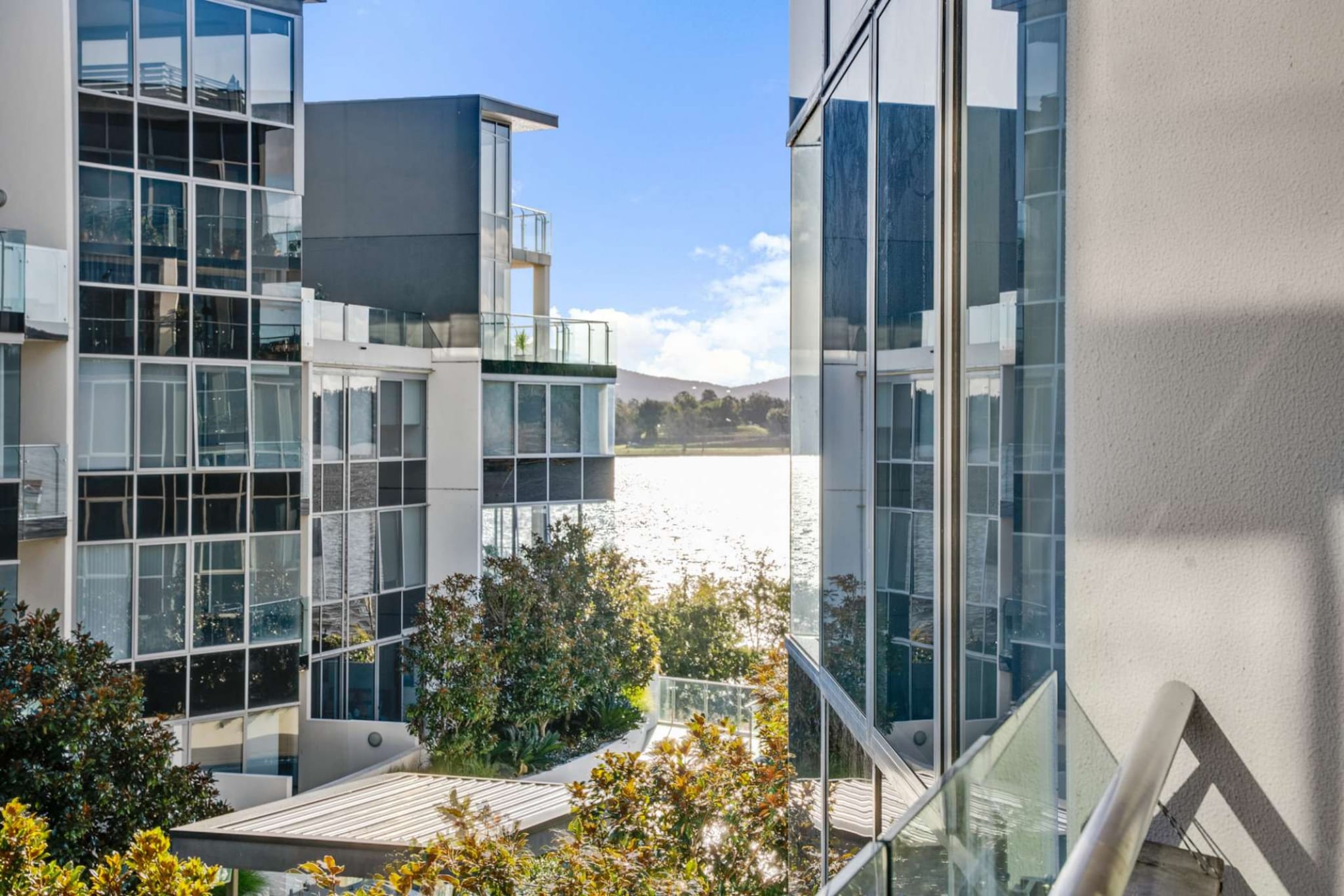 Relish in Canberra’s peaceful lakeside in this pristine 2-bed apartment perfect for those seeking elegance and convenience. Situated a short from the popular Kingston foreshore dining strip, shops and weekend markets indulge in the city's most iconic landmarks all a short drive away. Featuring a private balcony with outdoor lounge seating along with access to the on-site gym and outdoor infinity pool facilities, appreciate for yourself this modern property's perfect atmosphere.
The space
Modernly designed this idyllic apartment includes contemporary decor coupled with an abundance of natural light. Offering an open-plan living, a sleek kitchen, modern appliances, a polished bathroom, gorgeous bedrooms and a private balcony with outdoor lounge seating. Experience for yourself this property’s perfectly curated atmosphere with everything you’d need for an unforgettable stay.
 
Bedroom
- Bedroom 1: 1x Queen bed with blackout blinds
- Bedroom 2: 1x Queen bed
- A/C and heating
 
Living Room
- Plush couches and a coffee table
- TV with free-to-air and streaming options (use your own credentials)
- A/C and heater
- 5-seater dining table
 
Kitchen
- Fully equipped with cookware, utensils and cutlery
- Toaster, kettle, coffee machine and microwave
- Oven and a gas stovetop
- Dishwasher
 
Bathroom & Laundry
- Sleek bathrooms
- Laundry room available with a washer and dryer
- Travel essentials, towels and a hairdryer are provided
 
Amenity Notes
- Wi-Fi is available
- On-site parking available
- Private balcony with a generous outdoor lounge
- On-site gym facilities and an outdoor infinity pool
- A/C and heating available in the living and bedrooms
- Please note: For mid-stay clean requests, a cleaning service needs to be booked at $249.00 at guest cost.
Local area description
Kingston is a vibrant and trendy Canberra neighbourhood that borders the famous Lake Burley Griffin. Known for its contemporary foreshore with numerous cafes, restaurants, bars and boutique shops, take your pick of stores to explore. Kingston is also home to the famous Old Bus Depot Markets which offer an array of weekend vendors selling locally sourced goods and produce. Meanwhile, next door drop into Canberra Glassworks, which offers exhibitions and workshops. Peppered with parks and lakeside walks, all situated a short distance from the CBD, engross yourself in the Kingston atmosphere.
House rules
You are staying in a friendly and peaceful neighbourhood and we kindly ask you to respect the community and your surrounding neighbours. The following strict House Rules apply:
- No loud noise between 10 pm and 8 am
- No parties or antisocial behaviour
- No additional people are to access the property without our prior approval
- No smoking is allowed at any times
- If you break something, please let us know
- To help protect all floor coverings do not wear any shoes inside the property
 
Please be aware that excessive noise such as amplified music, vocals or screaming or anti-social behaviour in the property or common areas can cause neighbours to complain to us, the Building Manager, Council Rangers or Police.
 
IMPORTANT: Any breach of the House Rules may lead to a $500 fine plus compensation for any cost/damage created and immediate eviction of the property.
- Whilst we all love to travel with our furry friends, pets are available on request unless the property states it is pet friendly. Any stays with pets will incur an additional cleaning fee of $200.
 
Finally, when checking out, we kindly ask you for the following:
- Please leave all beds unmade
- Please clean up your dishes and put them away
- In case you have rearranged furniture, please put it back to the original location
- Please take out the rubbish and remember to use the right bins
- Please ensure all appliances, A/C and lights are off and doors and windows are closed
Interaction with guests
Welcome to MadeComfy! Our local team curates stays in exceptional Australian & New Zealand properties, ensuring style, comfort, and prime locations for discerning guests. We prioritise your needs to provide a memorable home-away-from-home experience. Explore our digital guidebooks for local recommendations, and don't hesitate to contact us throughout your stay. We're here to ensure your comfort – enjoy your stay with MadeComfy.
Notes
- For your comfort, this property is prepared with professional-grade hotel-style linen, including a three-sheet setup, ensuring a fresh and hygienic sleep experience.
- To access the on-site enter via the garage remote and the carapace is the first one on the left-hand side.
- There are stairs to the front door.
- Pets are welcome. Any stays with pets will incur an additional cleaning fee.
- Please note: For mid-stay clean requests, a cleaning service needs to be booked at $249.00 at guest cost.
 
Extra Services:
- Early check-in: Our standard check-in is at 3 pm. To guarantee early access to the property we suggest booking the night before if available. Otherwise, early check-in is subject to availability from the night before at an additional cost.
- Late check-out: Our standard check-out is at 10 am. To guarantee a later check-out of the property we suggest booking an additional night if available. Otherwise, a late check-out is subject to availability from the night before to an additional cost.
- Baggage: For security reasons, we are unable to receive or to keep unattended baggage before check-in or after check-out
- We provide a small welcome amenity pack to get your stay started
- This booking is protected with coverage for lost baggage and emergency medical expenses, provided by Travel Support with claim upto 500 AUD (T&C Applies). For more details reach out to Guest Support team post booking.
Access description
- You’ll have access to the entire property when you stay here, so it will feel like your own home.
- There are stairs to the front door.
- Key collection is offsite, 26 meters from the property and not available 24/7. Further details will be provided 3 days before check-in if your booking is successfully reserved.
Getting around
Public transport
The property is near three separate bus stops, on Wentworth Ave and Eyre St. These stops operate routes to Fyshwick, City, City West, Fraser and Queanbeyan. Meanwhile, the Canberra Railway Station operates trips via the Southern NSW line to Central Station in Sydney.
 
Ride sharing
There is plenty of taxi and ride-sharing options readily available throughout Canberra.
 
Points of Interest
Kingston Foreshore Dining Precinct - 1 minute (50m) walk away.
Old Bus Depot Markets and Canberra Glassworks - 5 minutes (400m) walk away.
Kingston Shopping Precinct - 12 minutes (950m) walk away.
 
Getting there
The property is approximately a 10-minute drive from Canberra Airport or a roughly 3-hour drive from Sydney’s CBD.