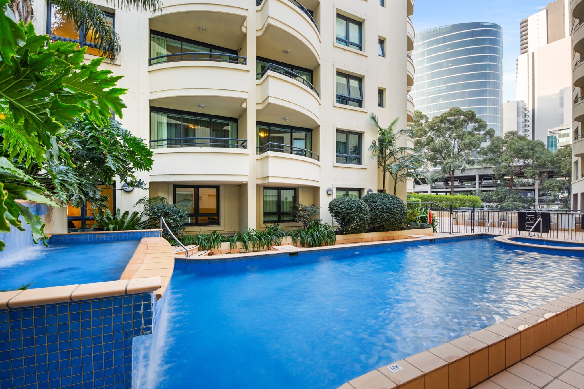 This modern and well-equipped apartment will suit those seeking a quiet place right in the middle of bustling Parramatta. With generous living spaces, funky decoration, and contemporary appliances, this unit is part of a hotel building that boasts access to a gorgeous swimming pool. You'll be minutes away from public transport, shopping, cafes, and Jubilee Park for a little bit of greenery. A pristine base for a business trip to Sydney's vibrant Parramatta.
The space
Located on the ground floor of a modern hotel building, this apartment space is generously distributed among each room. Featuring a sizeable kitchen that opens into a roomy living space, you'll have the stunning swimming pool as your backdrop. The bedroom offers a large window that guarantees plenty of natural light, a second TV and built-in robes. The unit also offers a polished bathroom, internal laundry, ducted air conditioning, self check-in, and access to the building's pool. The furniture is modern and comfy, and there’s lots of storage. Practicality, functionality and comfort are the best ways to describe this great find in the heart of Parramatta.
 
Living room
- Couch sits 2 people
- TV with free-to-air channels
 
Kitchen & Dining Area
- Fully equipped with cookware, utensils and cutlery
- Microwave, coffee machine and hotplate cooktop
- Dining area sits 2 people
 
Bathroom & Laundry
- Laundry room available with washer and dryer
- Travel essentials, towels and hairdryer provided
 
Amenity Notes
- Large windows and swimming pool views
- Swimming pool access
- Ducted A/C
- Wi-Fi is provided
- No parking. Parking & restaurant bookings can be organised at an extra charge directly payable to Mantra. Please contact Mantra to arrange.
- There is a phone system in the property that can be used to make free national calls