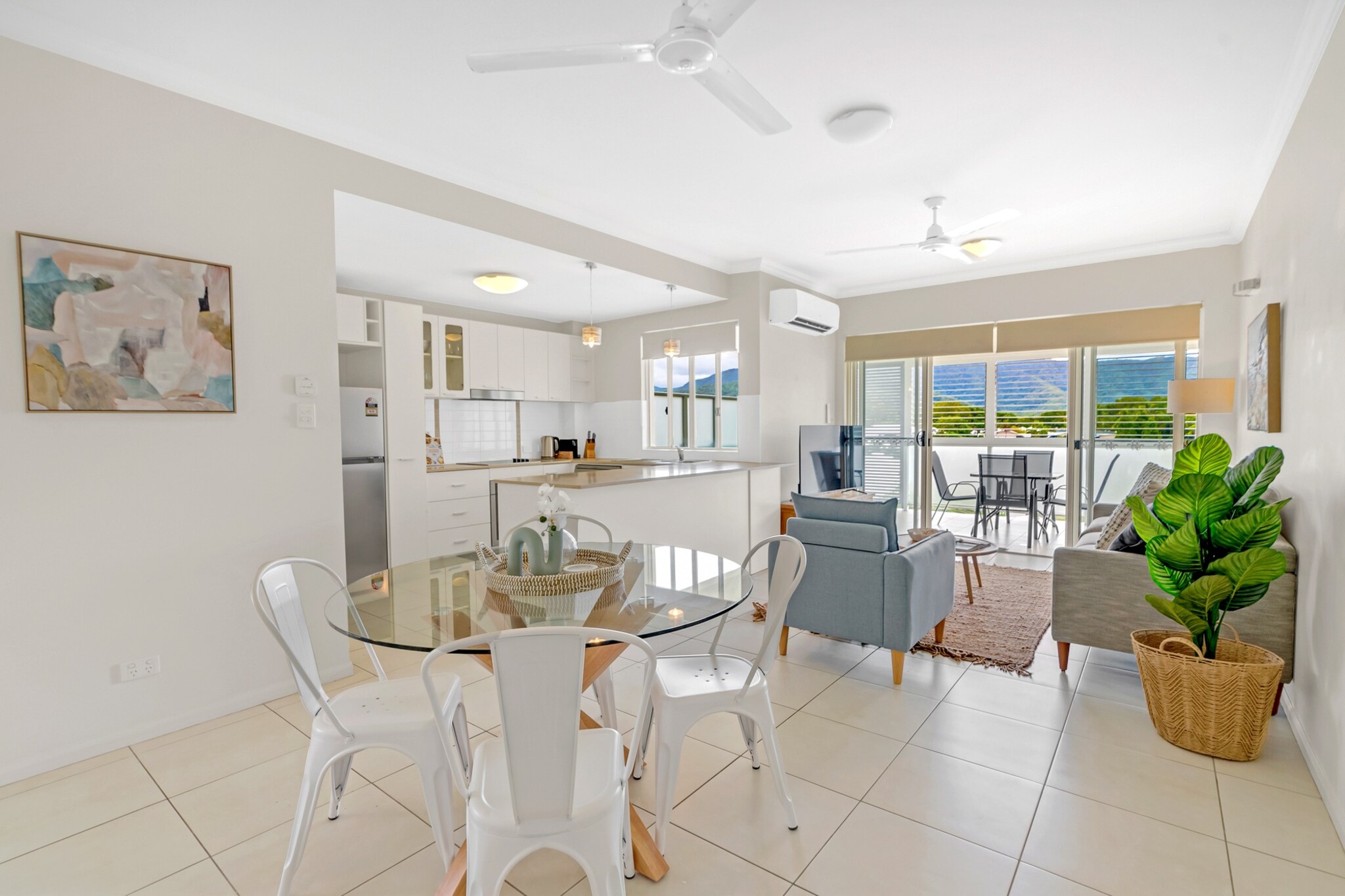 This charming 2-bed apartment is a mere 8-min stroll from the picturesque Trinity Beach. Boasting scenic views of this region's mix of rainforest and coastal landscapes, this property offers sunlit interiors, an inviting open-plan design, and the added perk of a Private swimming pool. Conveniently situated near restaurants, nature trails, public transport, and the beautiful beach, this home also features on-site parking and air conditioning. A perfect spot for a Queensland holiday.
The space
Modern, spacious and homely, this incredible apartment is the perfect choice for your next beach holiday. This lovely property features bright interiors, two bright bedrooms with private balconies, a fully-equipped kitchen, a generous bathroom with a walk-in shower, a large undercover verandah with a dining table, and access to a charming swimming pool — perfect for a hot Queensland day. With air conditioning and ceiling fans, internal laundry facilities, and on-site parking, this comfortable property is conveniently located only 600m from the netted swimming area of the beach or a 5-minute walk to the beach, situated across the road from the Trinity Beach Tavern, and within walking distance to shops, restaurants, parks, transport, and other neighbourhood attractions.
Living room
- Seating for 4 people
- TV with free air channels and Chromecast (connect your own apps to watch)
Kitchen & Dining Area
- Fully equipped with utensils and cutlery
- Oven and electric stovetop
- Dining area sits 4 people
Bathroom & Laundry
- Laundry room available with washer and dryer
- Travel essentials, towels and hairdryer provided
Amenity Notes
- Split A/C (heating + cooling) throughout
- Ceiling fans in living, dining and bedrooms
- Wi-Fi available
- Underground parking for 1 small vehicle
- Amenity access: private balcony with dining.
- Outdoor swimming pool
- Self check-in
- Stairs are required to access the front door of the property, including two flights of stairs, and may not be suitable for those with mobility issues.