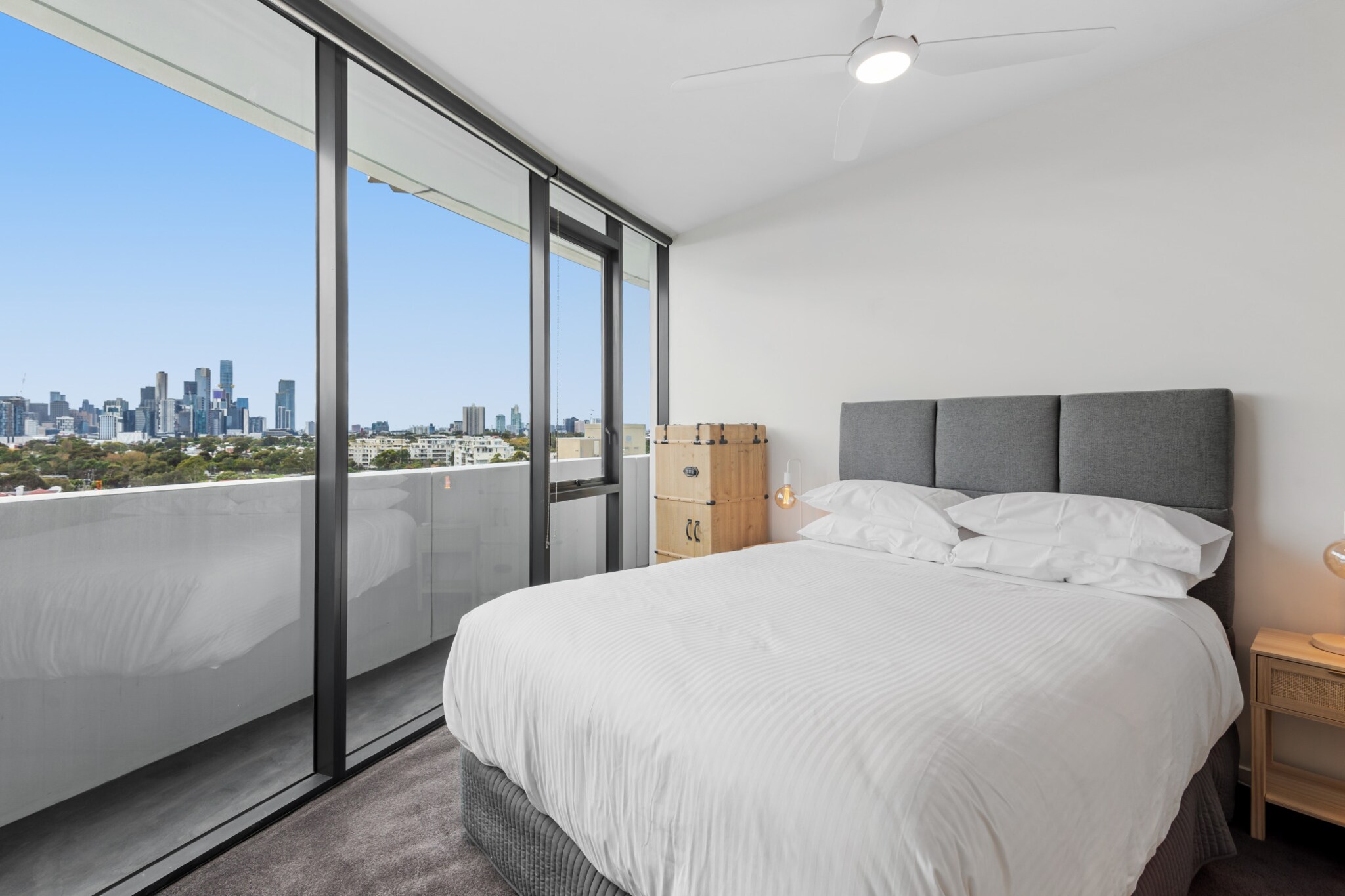 Sophisticated and with minimalist design, this incredible 2-bed apartment is a mere 500m from Port Melbourne Beach. Overlooking the Melbourne skyline from its private balcony, the property features comfortable interiors and impressive building amenities, such as a sauna, tennis court and pool. With restaurants, cafes and the ocean at your doorstep, you'll also be a mere 20-minute drive from the vibrant attractions of Melbourne's CBD.
The space
This incredible 2-bed, 2-bath apartment is a mere 500m from the beach! Nestled in an unbeatable location, step outside your door to find several charming cafes, restaurants, and bars. Beacon Cove's Promenade, perfect for walking or cycling, is just across the road leading you straight to the beach. Inside, the apartment boasts a tastefully designed open-plan living space, flooded with natural light and flowing seamlessly onto a private undercover balcony, with breath taking CBD skyline views. The sleek kitchen and cosy dining area complement the elegant interiors perfectly. Both bedrooms feature ceiling fans, and the polished bathrooms offer modern fixtures. Plus, enjoy comforts like air conditioning, on-site parking, internal laundry and access to outstanding building amenities, such as a swimming pool, tennis court, sauna, and fully equipped gym. With everything at your fingertips, this property promises an effortless and enjoyable stay.
 
Living room
- Couch seats 3 people
- TV with free air channels and streaming apps available (guests to use their own accounts)
 
Kitchen & Dining Area
- Fully equipped with utensils and cutlery
- Oven and gas stovetop
- Dining area sits 4 people and countertop area sits 3 people
 
Bathroom & Laundry
- Laundry room available with washer and dryer combo
- Travel essentials, towels and hairdryer provided