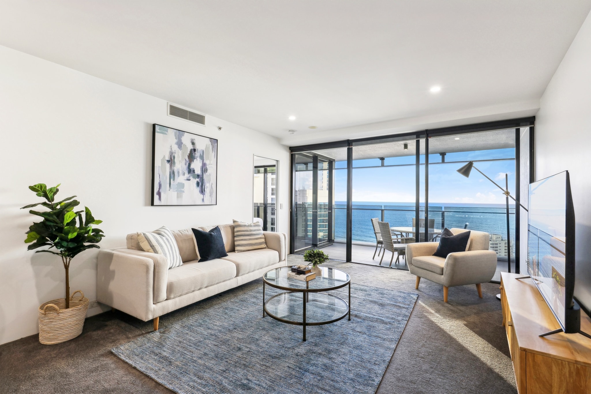 This stylish 2-bed apartment in iconic Surfers Paradise boasts modern, spacious, sunlit interiors. Located on a high floor, the airy, open-concept space provides the perfect blend of comfort and convenience. A mere 5-min walk from the beach, it features floor-to-ceiling windows and a generous balcony offering panoramic ocean views. Nearby, you'll find parks, shops, cafes, restaurants, as well as vibrant bars and nightclubs. A perfect place to escape by the sea!
The space
Are you dreaming of a holiday by the ocean in a property that feels contemporary, elegant and convenient? Set in the heights of a tall building, this fantastic Surfers Paradise apartment offers an open-plan layout overlooking the sparkling blue sea with a modern kitchen, a cosy living area, and a spacious balcony with an al fresco dining setup so you can have your morning coffee soaking in the region's natural beauty and water views from above. After a sunny day out, you can take a relaxing bath in the sleek bathroom whilst looking into the ocean! And the bedrooms are meticulously designed for your comfort. Enjoy the convenience of internal laundry, ducted air conditioning, fitted robes, and building amenities such as a pool, BBQ area, arcade, lounge room, and more. With Surfers Paradise's attractions right at your doorstep, this place promises an unforgettable sun-soaked getaway.
 
Living room
- Couch sits 4 people (3 seater + armchair)
- TV with free air channels and Netflix available (Guests use their own credentials)
 
Kitchen & Dining Area
- Fully equipped with utensils and cutlery
- Oven and electric stovetop
- Dining area sits 4 people
 
Bathroom & Laundry
- Laundry room available with washer and dryer
- Travel essentials, towels and hairdryer provided
 
Amenity Notes
- Ducted A/C
- Wi-Fi available
- Secure underground parking for 1 large vehicle
- Amenity access: private undercover balcony overlooking the ocean with al fresco dining; communal residential lounge (level 55); BBQ area, gym, two lagoons style pools and one indoor heated pool, spa, games room and arcade (levels 3 & 4), sauna/steam room, children's play area; and direct access to shopping.
Local area description
Surfers Paradise is a dynamic and bustling destination that attracts tourists from all over the world. Its combination of stunning natural beauty, modern amenities, and lively atmosphere makes it a popular choice for vacationers seeking sun, sea, and a vibrant social scene. It's known for its stunning sandy beaches, vibrant nightlife, and high-rise skyline — the Q1 building, which was once the tallest residential tower in the world, is one of the most prominent landmarks. The area is home to various shopping precincts and dining options. You'll find everything from boutique shops to large shopping centres like Chevron Renaissance and Circle on Cavill. There are also numerous restaurants, cafes, and bars offering a wide range of cuisines. Surfers Paradise is renowned for its lively nightlife which includes nightclubs, bars, and live music venues. The suburb has a light rail system, known as the G:link, which provides easy access to neighbouring suburbs and attractions.
House rules
You are staying in a friendly and peaceful neighbourhood and we kindly ask you to respect the community and your surrounding neighbours. The following strict House Rules apply:
 
- No loud noise between 10 pm and 8 am
- No parties or antisocial behaviour
- No additional people are to access the property without our prior approval
- No pets are allowed in the property without approval
- No smoking is allowed at any times
- If you break something, please let us know
- To help protect all floor coverings, do not wear any shoes inside the property
 
Please be aware that excessive noise such as amplified music, vocals or screaming or anti-social behaviour in the property or common areas can cause neighbours to complain to us, the Building Manager, Council Rangers or Police.
 
IMPORTANT:
- Any breach of the House Rules may lead to a $500 fine plus compensation for any cost/damage created and immediate eviction of the property without refund.
- No pets are allowed in the property without approval
 
Finally, when checking out, we kindly ask you for the following:
 
- Please leave all beds unmade
- Please clean up your dishes and put them away
- In case you have rearranged furniture, please put it back to the original location
- Please take out the rubbish and remember to use the right bins
- Please ensure all appliances, A/C and lights are off and doors and windows are closed.
- Please check your accommodation thoroughly before departing to avoid any unintentional items left behind.
 
We are not liable for any items left behind after your stay. In the rare event that a guest reports a missing item, we will make every effort to locate it for you, but we cannot guarantee its retrieval. If the item is found, we will gladly assist in arranging its return to an address within Australia, subject to postage and service fees.
Interaction with guests
Your stay will be hosted by local hospitality experts, which means you’ll have 24/7 support throughout your stay, from check-in to check-out. If you have a question or need help, we’re only a phone call or message away.
Notes
For your comfort, this property is prepared with professional-grade hotel-style linen, including a three-sheet setup, ensuring a fresh and hygienic sleep experience.
 
Extra Services:
- Early Check-in: Our standard check-in is at 3 pm. To guarantee early access to the property we suggest booking the night before if available. Otherwise, early check-in is subject to availability from the night before at an additional cost.
- Late check-out: Our standard check-out is at 10 am. To guarantee a later check-out of the property we suggest booking an additional night if available. Otherwise, a late check-out is subject to availability from the night before to an additional cost.
- Baggage: For security reasons, we are unable to receive or to keep unattended baggage before check-in or after check-out
- We provide a small welcome amenity pack to get your stay started.
- This booking is protected with coverage for lost baggage and emergency medical expenses, provided by Travel Support with claim upto 500 AUD (T&C Applies). For more details reach out to Guest Support team post booking.
Access description
- Key collection is offsite, 40-50 meters from the property and is available 24/7. Further details will be provided 3 days before check-in if your booking is successfully reserved.
Getting around
Public Transport
The closest bus stop is located 170 m away from the property on Ferny Ave. Surfers Paradise Ferry Wharf is located 170m from the property. The light rail station is 30 metres away from the property. 4 stops to the Convention Centre and Casino. 5 stops to Pacific Fair. Please visit Translink's website for more information.
 
Getting There
The property is located 27 km away from Gold Coast Airport. By car, the journey will take around 45 minutes. By public transportation, the journey will take around 55 minutes.