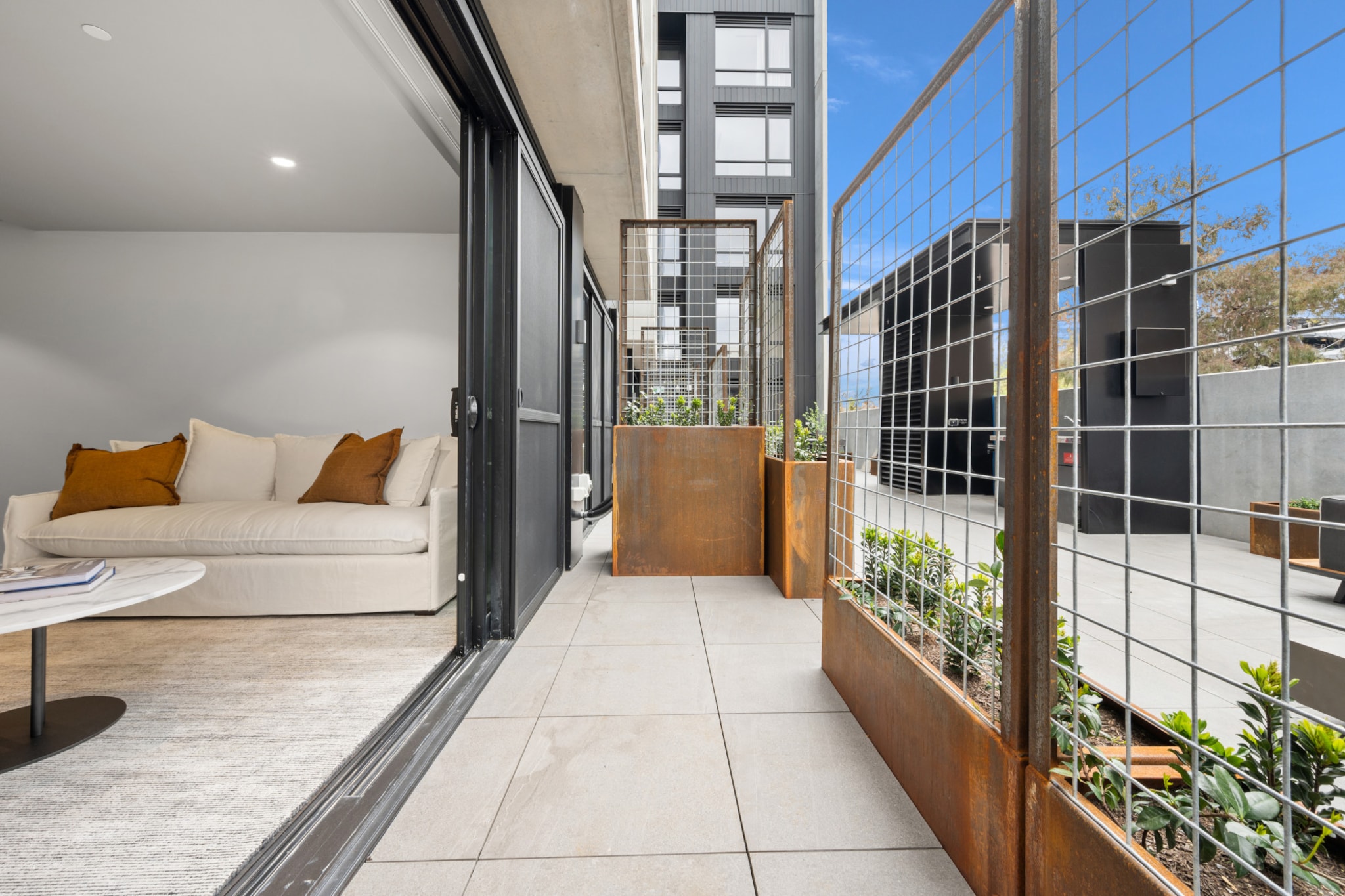 This stylish Braddon apartment captures the neighbourhood's trendy, elegant, and lively atmosphere. Just steps away from parks, restaurants, and public transport, the apartment offers air conditioning, onsite parking, and a communal alfresco dining area. With modern interiors that boast large windows, as well as brand-new amenities like pristine bathrooms and a contemporary kitchen, this high-standard home could be yours for the weekend.
The space
When you enter this designer apartment, you'll love the bright, spacious layout with large windows and a contemporary feel. The open-plan design connects the stylish kitchen and living areas, which opens onto the communal balcony and its dining area and BBQ facilities. Two king-sized bedrooms and one spa-like bathroom will make you feel at home from the first moment. You'll have air conditioning, access to laundry facilities, and onsite parking for added comfort. Staying at this unbeatable location means parks, restaurants, shops, and public transport are all close by. Plus, with self-check-in, you can look forward to an easy, hassle-free stay in this elegant apartment.
Living room
- Couch sits 2 people
- TV with Apple TV available
Kitchen & Dining Area
- Fully equipped with cookware, utensils and cutlery
- Oven and induction stovetop
Bathroom & Laundry
- Internal laundry facilities available
- Travel essentials, towels and hairdryer provided
Amenity Notes
- Split A/C (heating + cooling) throughout
- Wi-Fi available
- Parking for 1 vehicle
- Amenity access: access to a communal balcony with a BBQ area, dining area, and views (level 1)