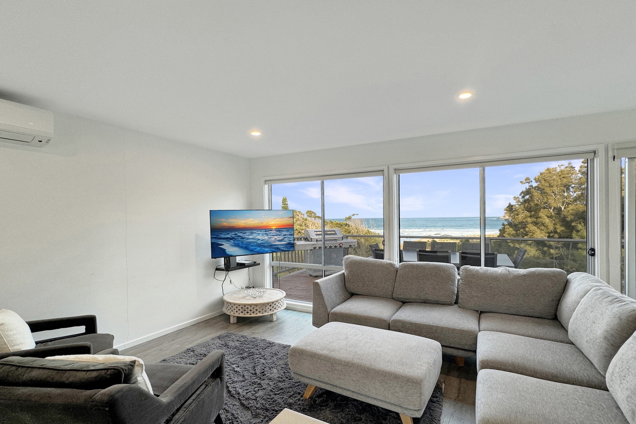 This spacious 4-bedroom beachside home, with two entrances, is perfect for families or groups of friends seeking a relaxing getaway. Boasting bright interiors, timber floors, and large windows, the home offers stunning ocean views. Equipped with A/C and modern furnishings, it creates a comfortable, laid-back vibe. Enjoy the expansive deck for BBQs and alfresco dining with the sound of the ocean in the background. Close to local amenities, this coastal retreat offers the perfect beach escape!
The space
Escape to this beautiful 4-bedroom, 2-bathroom home in Malua Bay, ideal for families or groups seeking a relaxing coastal getaway. This spacious retreat features an upstairs living area with two bedrooms, a bathroom, while the downstairs offers a kitchenette, two additional bedrooms and a second bathroom as well as and laundry facilities. Enjoy multiple outdoor areas, including a BBQ deck and a garden, perfect for alfresco dining with stunning ocean views. With two entrances, on-site parking, and modern amenities such as air conditioning and self-check-in, this home provides comfort and convenience for up to 7 guests. Just 650 meters from Malua Bay Beach, this tranquil escape is the perfect spot for your next beach adventure.
 
Living Areas
- Couch sits 7 people (Upstairs)
- Couch sits 5 people (Downstairs)
- TV's with free air channels & streaming available (guest's accounts required)
 
Kitchens & Dining Areas
- Both fully equipped with utensils and cutlery
- Oven and electric stovetop (Upstairs) & Microwave
- Dining area sits 8 people (Upstairs)
- Dining area sits 4 people(Downstairs)
 
Bathrooms & Laundry Room
- Laundry room available with washer and dryer (Downstairs)
- Travel essentials, towels and hairdryer provided
 
Amenity Notes
- Split A/C (heating + cooling) in the living area (upstairs & downstairs)
- Portable heaters and fans available
- Wi-Fi available upstairs & downstairs
- Driveway parking for 3 vehicles
- Upstairs: Large private deck overlooking the ocean with BBQ and alfresco dining setup
- Downstairs: Large undercover balcony overlooking the ocean with seating, BBQ and alfresco dining setup
Local area description
Malua Bay is a coastal suburb in New South Wales, located approximately 280 km south of Sydney and 13 km south of Batemans Bay. Known for its picturesque beaches, Malua Bay is a popular destination for tourists seeking a tranquil seaside experience. The area offers a variety of outdoor activities, such as swimming, surfing, and fishing, with the main beach being patrolled during the summer months. Malua Bay also has essential amenities, including shops, a medical centre, and dining options, making it a convenient and attractive place to live or visit. The suburb's natural beauty and relaxed lifestyle make it a cherished part of the Eurobodalla Shire.
House rules
You are staying in a friendly and peaceful neighbourhood and we kindly ask you to respect the community and your surrounding neighbours. The following strict House Rules apply:
 
- No loud noise between 10 pm and 8 am
- No parties or antisocial behaviour
- No additional people are to access the property without our prior approval
- No pets are allowed in the property without approval
- No smoking is allowed at any times
- If you break something, please let us know
- To help protect all floor coverings, do not wear any shoes inside the property
 
Please be aware that excessive noise such as amplified music, vocals or screaming or anti-social behaviour in the property or common areas can cause neighbours to complain to us, the Building Manager, Council Rangers or Police.
 
IMPORTANT:
- Any breach of the House Rules may lead to a $500 fine plus compensation for any cost/damage created and immediate eviction of the property without refund.
- Pets are available on request unless the property states it is pet friendly. Any stays with pets will incur an additional cleaning fee of $200.
 
Finally, when checking out, we kindly ask you for the following:
 
- Please leave all beds unmade
- Please clean up your dishes and put them away
- In case you have rearranged furniture, please put it back to the original location
- Please take out the rubbish and remember to use the right bins
- Please ensure all appliances, A/C and lights are off and doors and windows are closed.
- Please check your accommodation thoroughly before departing to avoid any unintentional items left behind.
 
We are not liable for any items left behind after your stay. In the rare event that a guest reports a missing item, we will make every effort to locate it for you, but we cannot guarantee its retrieval. If the item is found, we will gladly assist in arranging its return to an address within Australia, subject to postage and service fees.
Interaction with guests
Welcome to MadeComfy! Our local team curates stays in exceptional Australian & New Zealand properties, ensuring style, comfort, and prime locations for discerning guests. We prioritise your needs to provide a memorable home-away-from-home experience. Explore our digital guidebooks for local recommendations, and don't hesitate to contact us throughout your stay. We're here to ensure your comfort - enjoy your stay with MadeComfy.
Notes
For your comfort, this property is prepared with professional-grade hotel-style linen, including a three-sheet setup, ensuring a fresh and hygienic sleep experience.
 
NOTE:
- There are no internal stairs connecting the two floors
- The downstairs kitchen is a kitchenette.
- The laundry is located downstairs.
 
Extra Services:
- Early Check-in: Our standard check-in is at 3 pm. To guarantee early access to the property we suggest booking the night before if available. Otherwise, early check-in is subject to availability from the night before at an additional cost.
- Late check-out: Our standard check-out is at 10 am. To guarantee a later check-out of the property we suggest booking an additional night if available. Otherwise, a late check-out is subject to availability from the night before to an additional cost.
- Baggage: For security reasons, we are unable to receive or to keep unattended baggage before check-in or after check-out
- We provide a small welcome amenity pack to get your stay started.
- This booking is protected with coverage for lost baggage and emergency medical expenses, provided by Travel Support with claim upto 500 AUD (T&C Applies). For more details reach out to Guest Support team post booking.
Access description
- The key collection is located onsite. Further details will be provided 3 days before check-in if your booking is successfully reserved.
- Stairs are required to access the front door of the property upstairs
- The downstairs area has no stairs but is not wheelchair accessible
Getting around
Public Transport
The closest bus stop is located 550 m from the property on George Bass Dr after Kuppa Av. Please visit Transport NSW website for more information.
 
Getting There
The property is located 21 km away from Moruya Airport. By car, the journey will take around 20 minutes.