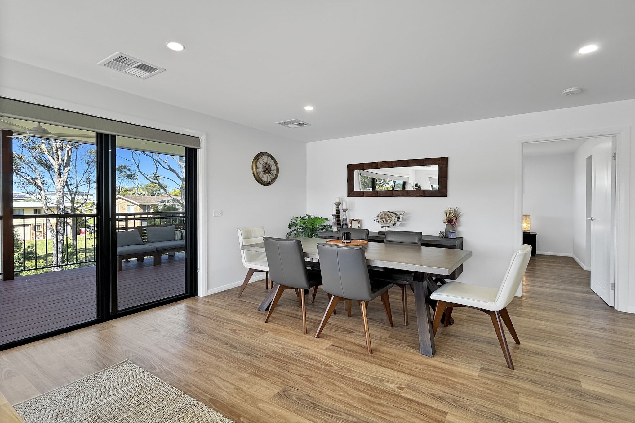 Property description
This impressive 4-bed home's large windows flood the interiors with natural light, creating a bright and airy atmosphere. The well-designed layout includes three comfortable living areas and a modern kitchen, perfect for hosting friends after a day at the nearby Malua Bay Beach, which is only 2 minutes away. Whether you're visiting the exotic animals at Mogo Wildlife Park or enjoying the scenic views at Moruya Heads Lookout, this home is perfectly positioned for a relaxing and enjoyable stay.

The space
This stunning 4-bed, 2-bath home in Malua Bay with a sunrise view is the perfect coastal destination. The beautiful bedrooms with two king and two queen beds exude comfort, and the polished bathrooms —one with a rain shower and one with a bath and an additional powder room — add a touch of luxury. Inside, sleek timber floors and modern furnishings add sophistication to the three spacious living areas and an open space downstairs for children to play. Outside, an undercover alfresco area with a BBQ and dining space will have you enjoying your morning coffee overlooking the landscape. With parking for two cars, ducted air conditioning, and ceiling fans, this home is as practical as it is elegant. Just minutes from Malua Bay Beach, 10 minutes away from Batemans Bay, 150m away from Malua Bay Club, close to all amenities like bottle shops, grocery, children's park at Malua Bay, and Close to local attractions such as Mogo Wildlife Park, where kangaroos might come to visit you, it's the perfect base for a peaceful holiday with family or friends.