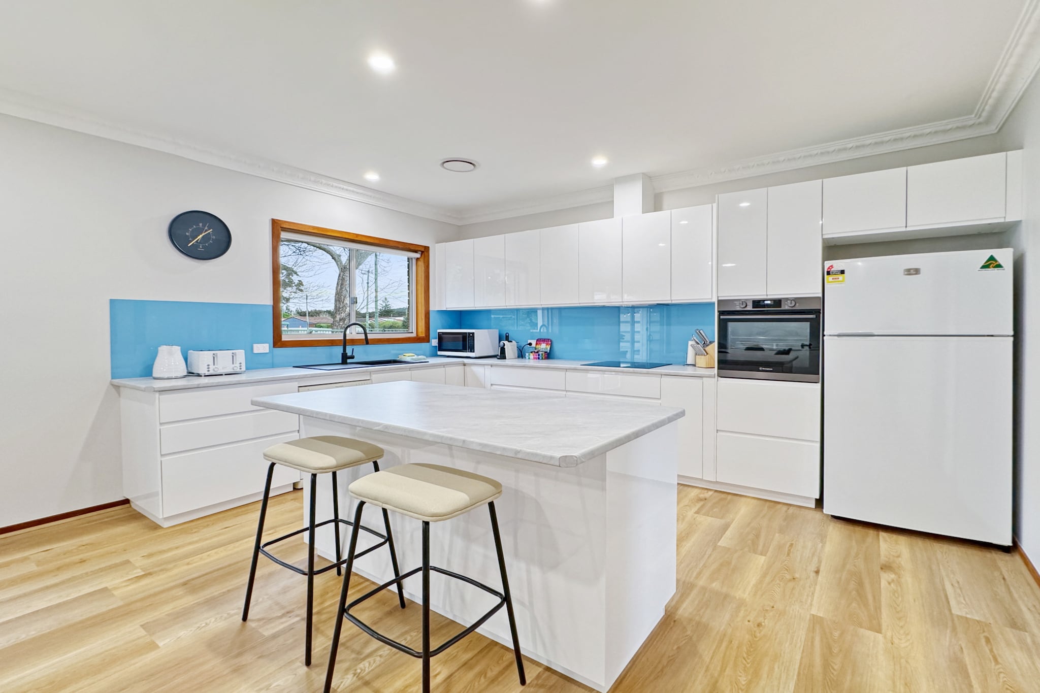 This homely 4-bedroom beach house offers the perfect setting for a Summer holiday. The well-thought-out layout features spacious living areas and a contemporary kitchen, ideal for entertaining after a day at the nearby Barlings Beach, just 3 minutes away by car. Whether you're exploring the scenic Tomakin Cove, enjoying a peaceful kayak on the Tomaga River, or taking a short drive to the stunning Batemans Bay, this home will help you find adventurous and chilled-out vibes.
The space
Spacious and modern, this 4-bed, 2-bath family home will blow you away! The property features three queen beds and two single beds, ensuring every guest is comfortable. The spa-like bathrooms offer modern fixtures and a touch of elegance. The open-plan layout showcases stunning timber floors and large windows, creating a bright, inviting atmosphere throughout the multiple living areas. Modern decor and sophisticated furnishings complement the spacious interiors. Outside, the green garden includes an undercover alfresco area with a BBQ and dining setup, perfect for enjoying meals in the fresh air, whilst ducted air conditioning and ceiling fans inside provide comfort throughout the seasons. Just minutes from Barlings Beach and close to Tomakin Cove and Batemans Bay, nothing is missing in this stunning property.
 
Living room
- Couch sits 8 people
- TV with free-to-air channels & streaming available (guests to use their own credentials)
 
Kitchen & Dining Area
- Fully equipped with utensils and cutlery
- Oven and induction stovetop
- The dining area sits 8 people and counter-top area sits 2 people
 
Bathroom & Laundry
- Laundry room available with washer and dryer
- Travel essentials, towels and hairdryer provided
- There is an outdoor shower conveniently located behind the laundry, providing an added touch of comfort to your stay.
 
Amenity Notes
- Ducted A/C (heating + cooling) throughout
- Ceiling fans in bedrooms
- Wi-Fi available
- Garage and driveway parking for 2 vehicles
- Amenity access: garden, BBQ area alfresco dining
Local area description
Tomakin, a peaceful coastal village in New South Wales, is nestled between the scenic towns of Batemans Bay and Moruya. Known for its stunning beaches, such as Tomakin Cove and Barlings Beach, it offers a relaxed atmosphere perfect for swimming, surfing, and fishing. The village is surrounded by natural beauty, including the Tomaga River, where visitors can enjoy kayaking or a leisurely stroll along its banks. With a tight-knit community, Tomakin maintains a laid-back lifestyle, while still offering easy access to nearby amenities and attractions, making it a hidden gem on the South Coast.
House rules
You are staying in a friendly and peaceful neighbourhood and we kindly ask you to respect the community and your surrounding neighbours. The following strict House Rules apply:
 
- No loud noise between 10 pm and 8 am
- No parties or antisocial behaviour
- No additional people are to access the property without our prior approval
- No pets are allowed in the property without approval
- No smoking is allowed at any times
- If you break something, please let us know
- To help protect all floor coverings, do not wear any shoes inside the property
 
Please be aware that excessive noise such as amplified music, vocals or screaming or anti-social behaviour in the property or common areas can cause neighbours to complain to us, the Building Manager, Council Rangers or Police.
 
IMPORTANT:
- Any breach of the House Rules may lead to a $500 fine plus compensation for any cost/damage created and immediate eviction of the property without refund.
- Pets are available on request unless the property states it is pet friendly. Any stays with pets will incur an additional cleaning fee of $200.
 
Finally, when checking out, we kindly ask you for the following:
 
- Please leave all beds unmade
- Please clean up your dishes and put them away
- In case you have rearranged furniture, please put it back to the original location
- Please take out the rubbish and remember to use the right bins
- Please ensure all appliances, A/C and lights are off and doors and windows are closed.
- Please check your accommodation thoroughly before departing to avoid any unintentional items left behind.
 
We are not liable for any items left behind after your stay. In the rare event that a guest reports a missing item, we will make every effort to locate it for you, but we cannot guarantee its retrieval. If the item is found, we will gladly assist in arranging its return to an address within Australia, subject to postage and service fees.
Interaction with guests
Welcome to MadeComfy! Our local team curates stays in exceptional Australian & New Zealand properties, ensuring style, comfort, and prime locations for discerning guests. We prioritise your needs to provide a memorable home-away-from-home experience. Explore our digital guidebooks for local recommendations, and don't hesitate to contact us throughout your stay. We're here to ensure your comfort - enjoy your stay with MadeComfy.
Notes
For your comfort, this property is prepared with professional-grade hotel-style linen, including a three-sheet setup, ensuring a fresh and hygienic sleep experience.
 
Extra Services:
- Early Check-in: Our standard check-in is at 3 pm. To guarantee early access to the property we suggest booking the night before if available. Otherwise, early check-in is subject to availability from the night before at an additional cost.
- Late check-out: Our standard check-out is at 10 am. To guarantee a later check-out of the property we suggest booking an additional night if available. Otherwise, a late check-out is subject to availability from the night before to an additional cost.
- Baggage: For security reasons, we are unable to receive or to keep unattended baggage before check-in or after check-out
- We provide a small welcome amenity pack to get your stay started.
- This booking is protected with coverage for lost baggage and emergency medical expenses, provided by Travel Support with claim upto 500 AUD (T&C Applies). For more details reach out to Guest Support team post booking.
Access description
- The key collection is located onsite. Further details will be provided 3 days before check-in if your booking is successfully reserved.
- This property is Wheelchair Accessible.
Getting around
Public Transport
The closest bus stop is located 92 m from the property on Sunpatch Pde at Kingston Pl. Please visit Transport NSW website for more information.
 
Getting There
The property is located 13 km away from Moruya Airport. By car, the journey will take around 10 minutes.