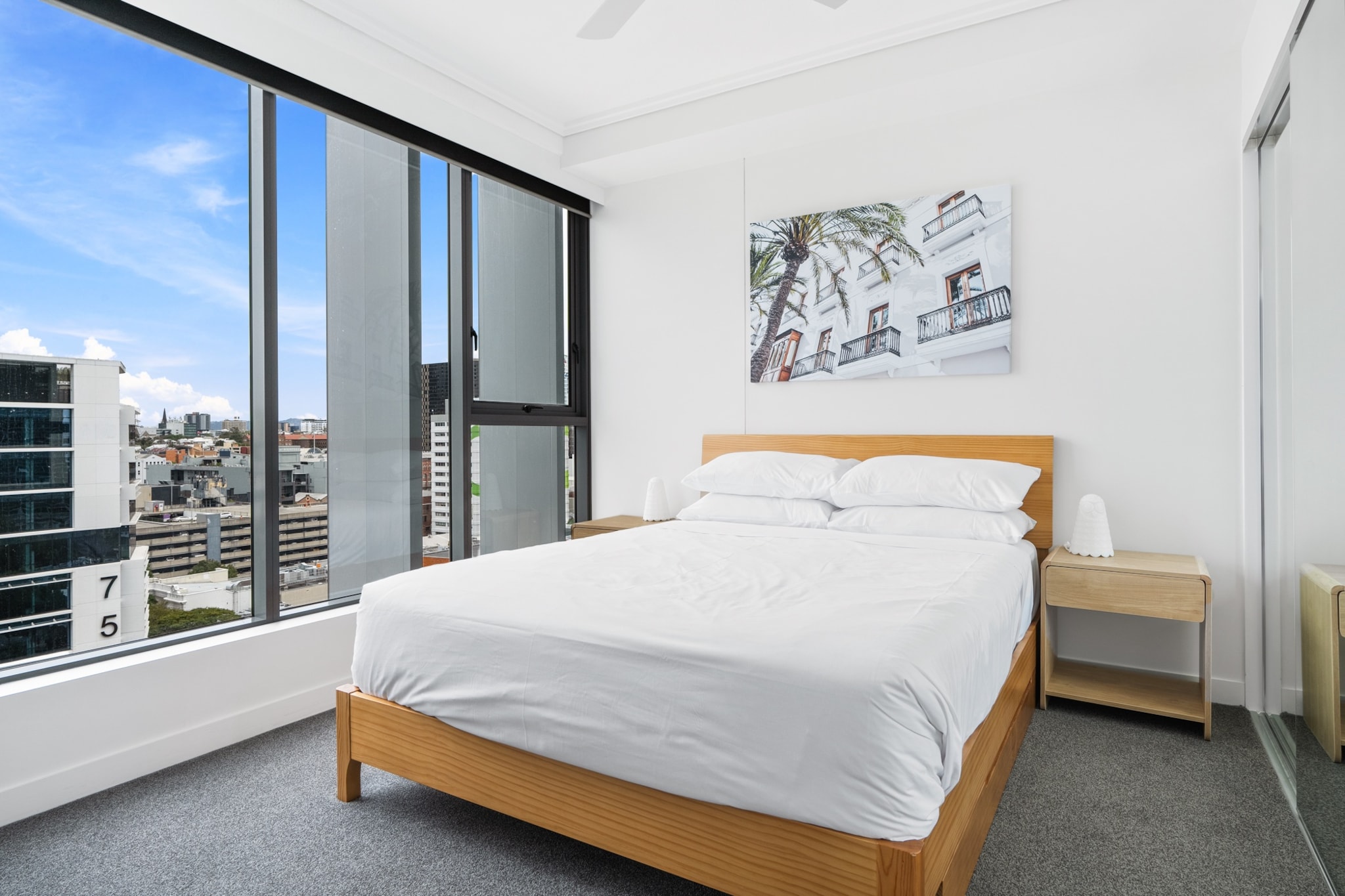 This modern 1-bed home offers stunning views through floor-to-ceiling windows that fill the space with natural light. The property includes A/C, access to a private balcony and communal facilities such as a sparkling swimming pool. Just minutes away, you’ll find the Brisbane Riverwalk, the iconic Story Bridge, and the trendy boutiques and cafes of James Street. The Fortitude Music Hall is also only a 5-min walk away, making this apartment ideal for exploring everything Brisbane has to offer.
The space
This bright and spacious apartment will make a perfect base with all the comforts you need for an unforgettable stay. With an open-plan layout, the contemporary kitchen flows effortlessly into the living and dining areas, with floor-to-ceiling windows showcasing stunning views of the Brisbane skyline. The hotel-like bedroom, equipped with a comfortable queen bed, includes a vanity desk that can also serve as a study nook, and ceiling fan for hot QLD days, whilst the stylish bathroom offers a sleek walk-in shower. Step out onto the private balcony to relax, or take advantage of building amenities like the communal garden and swimming pool. With split A/C and internal laundry, everything you need awaits!
Living room
- Couch sits 2 people
- TV with free-to-air channels & streaming available (guests to use their own credentials)
Kitchen & Dining Area
- Fully equipped with utensils and cutlery
- Oven and electric stovetop
- The dining area sits 2 people and the countertop area sits 2 people
Bathroom & Laundry
- Laundry room available with washer and dryer
- Travel essentials, towels and hairdryer provided
Amenity Notes
- Split A/C (heating + cooling)
- Ceiling fans in the living area and bedroom
- Wi-Fi available
- Vanity in bedroom
- No dedicated parking but a secure 24/7 paid commercial car park is available
- Private balcony with seating
- Communal garden, alfresco dining area and swimming pool for use