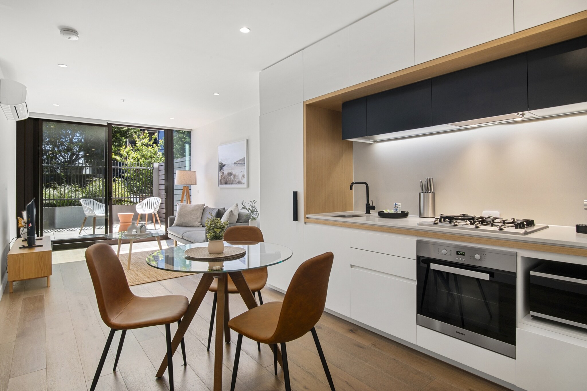 This elevated 1-bed property features stunning interiors and a convenient location by waterfront restaurants, cafes, and bars. The building grants guests sophisticated amenities, including a pool and gym. You'll also be nearby the vibrant District Docklands Shopping Centre and the Melbourne Star Observation Wheel. Additionally, attractions like the Melbourne Aquarium and the iconic Marvel Stadium are within easy reach. For a fun-packed holiday, this apartment has got you covered.
The space
Experience the charm of Docklands in this beautifully modern garden apartment with bright, spacious interiors. This 1-bed, 1-bath features an open-plan design that seamlessly connects the kitchen, dining, and living areas, perfect for entertaining. The inviting bedroom includes a built-in robe and natural light. The luxurious bathroom boasts a walk-in rain shower for a spa-like experience. Enjoy outdoor living on your private patio, ideal for alfresco dining. Residents have access to amenities like a communal swimming pool, gym, and courtyard. With secure parking, A/C, and other comforts, this gem is just a short walk from local hospitality venues and the iconic Marvel Stadium.
Living room
- Couch sits 4 people
- TV with free-to-air channels & streaming available (guests to use their own credentials)
Kitchen & Dining Area
- Fully equipped with utensils and cutlery
- Oven and gas stovetop
- Dining area sits 4 people
Bathroom & Laundry
- Laundry room available with washer and dryer combo
- Travel essentials, towels and hairdryer provided
Amenity Notes
- Split A/C (heating + cooling) in living area
- Free Garage parking for 1 vehicle (max. height 2.1 m)
- Private patio with alfresco dining
- Communal swimming pool, gym, and courtyard
- Sauna & spa
- Library/study area
- The study room includes a desk, lamp, and painting.
Local area description
Docklands, located on the waterfront in Melbourne, is a modern and bustling suburb characterised by its high-rise residential buildings, commercial spaces, and vibrant cultural scene. Once an industrial port area, Docklands has undergone extensive urban redevelopment, transforming it into a dynamic district with stunning views of Victoria Harbour. With its proximity to the CBD and excellent public transport, Docklands has easy access to amenities, entertainment venues, and recreational activities. Its picturesque waterfront setting also offers harbour cruises, water sports, and more. Docklands offers a unique blend of urban living and waterfront charm, making it an attractive and thriving part of Melbourne.
House rules
You are staying in a friendly and peaceful neighbourhood and we kindly ask you to respect the community and your surrounding neighbours. The following strict House Rules apply:
- No loud noise between 10 pm and 8 am
- No parties or antisocial behaviour
- No additional people are to access the property without our prior approval
- No smoking is allowed at any times
- If you break something, please let us know
- To help protect all floor coverings, do not wear any shoes inside the property
Please be aware that excessive noise such as amplified music, vocals or screaming or anti-social behaviour in the property or common areas can cause neighbours to complain to us, the Building Manager, Council Rangers or Police.
IMPORTANT:
- Any breach of the House Rules may lead to a $500 fine plus compensation for any cost/damage created and immediate eviction of the property without refund.
Finally, when checking out, we kindly ask you for the following:
- Please leave all beds unmade
- Please clean up your dishes and put them away
- In case you have rearranged furniture, please put it back to the original location
- Please take out the rubbish and remember to use the right bins
- Please ensure all appliances, A/C and lights are off and doors and windows are closed.
- Please check your accommodation thoroughly before departing to avoid any unintentional items left behind.
We are not liable for any items left behind after your stay. In the rare event that a guest reports a missing item, we will make every effort to locate it for you, but we cannot guarantee its retrieval. If the item is found, we will gladly assist in arranging its return to an address within Australia, subject to postage and service fees.
Interaction with guests
Welcome to MadeComfy! Our local team curates stays in exceptional Australian & New Zealand properties, ensuring style, comfort, and prime locations for discerning guests. We prioritise your needs to provide a memorable home-away-from-home experience. Explore our digital guidebooks for local recommendations, and don't hesitate to contact us throughout your stay. We're here to ensure your comfort - enjoy your stay with MadeComfy.
Notes
For your comfort, this property is prepared with professional-grade hotel-style linen, including a three-sheet setup, ensuring a fresh and hygienic sleep experience.
Extra Services:
- Early Check-in: Our standard check-in is at 3 pm. To guarantee early access to the property we suggest booking the night before if available. Otherwise, early check-in is subject to availability from the night before at an additional cost.
- Late check-out: Our standard check-out is at 10 am. To guarantee a later check-out of the property we suggest booking an additional night if available. Otherwise, a late check-out is subject to availability from the night before to an additional cost.
- Baggage: For security reasons, we are unable to receive or to keep unattended baggage before check-in or after check-out
- We provide a small welcome amenity pack to get your stay started.
- This booking is protected with coverage for lost baggage and emergency medical expenses, provided by Travel Support with claim upto 500 AUD (T&C Applies). For more details reach out to Guest Support team post booking.
Access description
- The key collection is located offsite and not available 24/7. Further details will be provided 3 days before check-in if your booking is successfully reserved.
Getting around
Public Transport
The closest tram stop is located 500 metres from the property on Waterfront City/Footscray Rd.
Getting There
The property is located 22 km away from Melbourne Airport. By car, the journey will take around 20 minutes. By public transport, the journey will take around 50 minutes.