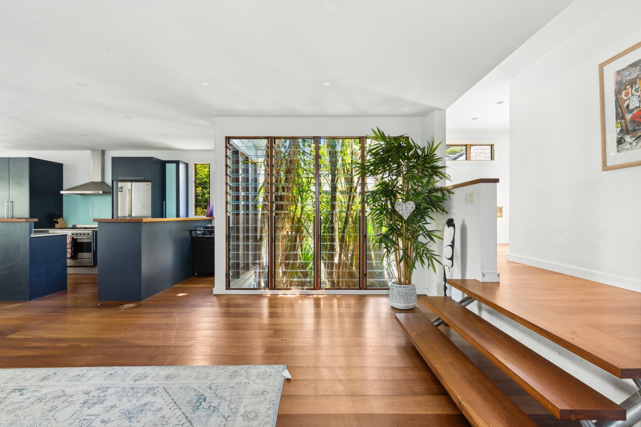 Experience serene living in this spacious 3-bedroom home nestled in North Balgowlah. Featuring a large garden, stylish interiors, and multiple living spaces, it’s perfect for families or groups. Enjoy climate-controlled comfort, four bathrooms, and self-check-in convenience. Relax in the expansive living areas or explore nearby nature reserves and local cafés. Make this peaceful retreat your base for a memorable Sydney escape.
The space
This elegant 3-bedroom, 4-bathroom house perfectly blends comfort and style, making it an ideal retreat for families or groups. The main bedroom features a luxurious walk-in wardrobe and en-suite, while the additional queen and double bedrooms come equipped with wall-mounted fans and air conditioning for ultimate comfort. The expansive living area offers seating for seven, a large TV with streaming services, and tasteful décor, creating a welcoming space to relax. The property is fully fenced, ensuring privacy and security, and seamlessly connects to multiple outdoor seating areas, a balcony with a dining setup, and a private garden featuring sun loungers, a basketball net, table tennis, and lush grass—perfect for alfresco dining and relaxation. For entertainment, there's a dedicated games room with a pool table, an additional living and kitchen area downstairs, and a dedicated study space complete with a desk, chair, and air conditioning. With its wooden floors, abundant natural light, and thoughtful amenities, this home provides a peaceful and stylish haven for any getaway.
Upstairs Living Room
-Couch seats 7 people
-TV with free-to-air and streaming services (guests to use their own credentials)
Downstairs Living Room
- Couch seats 4 people
-TV with free-to-air and streaming services (guests to use their own credentials)
Kitchen & Dining Area
- Main kitchen upstairs + kitchen in games rooms
-Fully equipped with cutlery and utensils
-Gas oven and stovetop
-Dining area seats 9 people + downstairs dining seats 6
Bathrooms & Laundry
- 3 bathrooms upstairs and 1 bathroom downstairs in the games room
-Laundry room available with washer and dryer
-Travel essentials, towels and hairdryer provided
Amenity Notes
-Onsite driveway parking for up to 3 cars
-Air conditioning and heating in all bedrooms and living areas
-Ceiling fans in all bedrooms
-Game room with pool table
-Dedicated study area with desk, chair and A/C
-Balcony with dining setup
-Private garden with sun loungers, table tennis and basketball net
Local area description
Tucked away in a peaceful suburb, North Balgowlah combines natural beauty with everyday convenience. Explore scenic bushwalks at the nearby Manly Dam Reserve, indulge in boutique shopping and dining in Seaforth, or soak up the sun at Manly’s iconic beaches, just a short drive away. With charming cafés, family-friendly parks, and a welcoming community vibe, North Balgowlah offers the perfect setting for a relaxing Sydney escape.
House rules
You are staying in a friendly and peaceful neighbourhood and we kindly ask you to respect the community and your surrounding neighbours. The following strict House Rules apply:
- No loud noise between 10 pm and 8 am
- No parties or antisocial behaviour
- No additional people are to access the property without our prior approval
- No pets are allowed in the property without approval
- No smoking is allowed at any times
- If you break something, please let us know
- To help protect all floor coverings, do not wear any shoes inside the property
Please be aware that excessive noise such as amplified music, vocals or screaming or anti-social behaviour in the property or common areas can cause neighbours to complain to us, the Building Manager, Council Rangers or Police.
IMPORTANT:
- Any breach of the House Rules may lead to a $500 fine plus compensation for any cost/damage created and immediate eviction of the property without refund.
- Pets are available on request unless the property states it is pet friendly. Any stays with pets will incur an additional cleaning fee of $200.
Finally, when checking out, we kindly ask you for the following:
- Please leave all beds unmade
- Please clean up your dishes and put them away
- In case you have rearranged furniture, please put it back to the original location
- Please take out the rubbish and remember to use the right bins
- Please ensure all appliances, A/C and lights are off and doors and windows are closed.
- Please check your accommodation thoroughly before departing to avoid any unintentional items left behind.
We are not liable for any items left behind after your stay. In the rare event that a guest reports a missing item, we will make every effort to locate it for you, but we cannot guarantee its retrieval. If the item is found, we will gladly assist in arranging its return to an address within Australia, subject to postage and service fees.
Interaction with guests
Welcome to MadeComfy! Our local team curates stays in exceptional Australian & New Zealand properties, ensuring style, comfort, and prime locations for discerning guests. We prioritise your needs to provide a memorable home-away-from-home experience. Explore our digital guidebooks for local recommendations, and don't hesitate to contact us throughout your stay. We're here to ensure your comfort - enjoy your stay with MadeComfy.
Notes
- For your comfort, this property is prepared with professional-grade hotel-style linen, including a three-sheet setup, ensuring a fresh and hygienic sleep experience.
-The property is located in a peaceful suburban area surrounded by lush natural flora and fauna. Due to this environment, guests may occasionally encounter insects such as spiders and cockroaches throughout the year.
- Games room/Downstairs: Furnished with a living space, TV (with free-to-air and streaming options), A/C, kitchen with dishwasher, washing machine, oven, microwave and electric stove top and bathroom with shower.
- Please be advised that the spa in the garden is not available for guest use and is not included as an amenity for this property.
Extra Services:
- Early Check-in: Our standard check-in is at 3 pm. To guarantee early access to the property we suggest booking the night before if available. Otherwise, early check-in is subject to availability from the night before at an additional cost.
- Late check-out: Our standard check-out is at 10 am. To guarantee a later check-out of the property we suggest booking an additional night if available. Otherwise, a late check-out is subject to availability from the night before to an additional cost.
- Baggage: For security reasons, we are unable to receive or to keep unattended baggage before check-in or after check-out
- We provide a small welcome amenity pack to get your stay started.
- This booking is protected with coverage for lost baggage and emergency medical expenses, provided by Travel Support with claim upto 500 AUD (T&C Applies). For more details reach out to Guest Support team post booking.
Access description
Key collection is onsite. Further details will be provided 3 days before check-in if your booking is successfully reserved.
Getting around
Public Transport: Bus services connect North Balgowlah to the CBD and northern beaches.
Getting There: Sydney Airport is a 40-minute drive; Sydney CBD is 20 minutes by car.