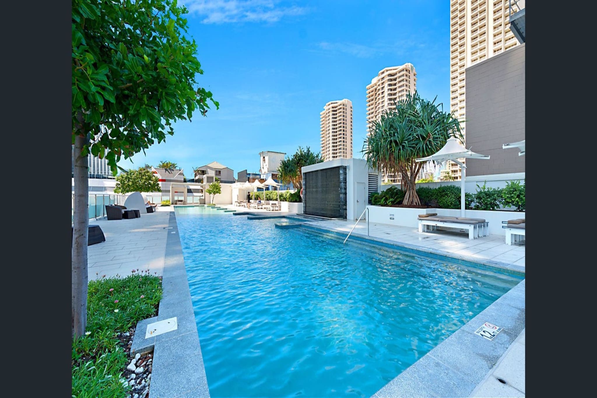 This modern 2-bedroom apartment in Surfers Paradise offers comfort and convenience for families or groups. Featuring 2 king beds and a sofa bed, itâ€™s perfect for those looking to enjoy a spacious retreat. The apartment boasts a private balcony, access to a pool and gym, and is just a short walk to local shops and the beach. With air conditioning, secure parking, and a fully equipped kitchen, this property is the ideal choice for a relaxed getaway.
The space
This bright and spacious 2-bedroom apartment is designed for comfort and relaxation. The open-plan layout includes a generous living area with a sofa bed, and large windows, allowing natural light to flood the space. Step outside onto the private balcony, perfect for enjoying a morning coffee or evening drink. The modern kitchen is equipped with all the necessary appliances for self-catering, while the dining area comfortably accommodates six guests. The master bedroom has a king bed, and the second bedroom also features a king bed, making it perfect for families or groups. Both bedrooms are fitted with blackout blinds to ensure a restful night's sleep. With air conditioning and heating throughout, this apartment offers year-round comfort.
 
Living Room
-Couch seats 2 people + 2 armchairs
-Sofa bed for 1 additional guest
-TV with Free-to-Air and streaming services (guests to use their own credentials)
 
Kitchen & Dining Area
-Fully equipped with cutlery and utensils
-Electric oven and stovetop
-Dining area seats 6
 
Bathroom & Laundry
-Laundry room available with washer and dryer
-Travel essentials, towels, and hairdryer provided
 
Amenity Notes
-Onsite parking available with a height restriction of 2.2 metres
-Ducted A/C (heating + cooling) throughout
-Private balcony with outdoor seating for 4
-Building amenities: Pool and Gym located on level 2, outdoor pool and lounge area and onsite restaurants.
- Linen for the sofa bed is provided and can be found in the cupboard for guests to set up when needed.
Local area description
Located in the heart of Surfers Paradise, this apartment is just steps away from the beach and local attractions. Explore the nearby shops, cafes, and restaurants or enjoy a day at the pool. With easy access to public transport, the property is a great base for exploring all that Surfers Paradise has to offer.
House rules
You are staying in a friendly and peaceful neighbourhood and we kindly ask you to respect the community and your surrounding neighbours. The following strict House Rules apply:
 
- No loud noise between 10 pm and 8 am
- No parties or antisocial behaviour
- No additional people are to access the property without our prior approval
- No pets are allowed in the property without approval
- No smoking is allowed at any times
- If you break something, please let us know
- To help protect all floor coverings, do not wear any shoes inside the property
 
Please be aware that excessive noise such as amplified music, vocals or screaming or anti-social behaviour in the property or common areas can cause neighbours to complain to us, the Building Manager, Council Rangers or Police.
 
IMPORTANT:
- Any breach of the House Rules may lead to a $500 fine plus compensation for any cost/damage created and immediate eviction of the property without refund.
- Pets are available on request unless the property states it is pet friendly. Any stays with pets will incur an additional cleaning fee of $200.
 
Finally, when checking out, we kindly ask you for the following:
 
- Please leave all beds unmade
- Please clean up your dishes and put them away
- In case you have rearranged furniture, please put it back to the original location
- Please take out the rubbish and remember to use the right bins
- Please ensure all appliances, A/C and lights are off and doors and windows are closed.
- Please check your accommodation thoroughly before departing to avoid any unintentional items left behind.
 
We are not liable for any items left behind after your stay. In the rare event that a guest reports a missing item, we will make every effort to locate it for you, but we cannot guarantee its retrieval. If the item is found, we will gladly assist in arranging its return to an address within Australia, subject to postage and service fees.
Interaction with guests
Welcome to MadeComfy! Our local team curates stays in exceptional Australian & New Zealand properties, ensuring style, comfort, and prime locations for discerning guests. We prioritise your needs to provide a memorable home-away-from-home experience. Explore our digital guidebooks for local recommendations, and don't hesitate to contact us throughout your stay. We're here to ensure your comfort - enjoy your stay with MadeComfy.
Notes
- Linen for the sofa bed is provided and can be found in the cupboard for guests to set up when needed.
 
For your comfort, this property is prepared with professional-grade hotel-style linen, including a three-sheet setup, ensuring a fresh and hygienic sleep experience.
 
Extra Services:
- Early Check-in: Our standard check-in is at 3 pm. To guarantee early access to the property we suggest booking the night before if available. Otherwise, early check-in is subject to availability from the night before at an additional cost.
- Late check-out: Our standard check-out is at 10 am. To guarantee a later check-out of the property we suggest booking an additional night if available. Otherwise, a late check-out is subject to availability from the night before to an additional cost.
- Baggage: For security reasons, we are unable to receive or to keep unattended baggage before check-in or after check-out
- We provide a small welcome amenity pack to get your stay started.
- This booking is protected with coverage for lost baggage and emergency medical expenses, provided by Travel Support with claim upto 500 AUD (T&C Applies). For more details reach out to Guest Support team post booking.
Access description
Key collection is at nearby location Further details will be provided 3 days before check-in if your booking is successfully reserved.
Getting around
Public Transport
Bus stops are within walking distance, providing easy access to Bondi Junction, the City, and surrounding areas.
Edgecliff Train Station is just a short distance away, with direct services to Bondi Junction, the City, and beyond.
 
Getting There
The property is approximately a 20-minute drive from Sydney Airport and around 15 minutes from the CBD by car.