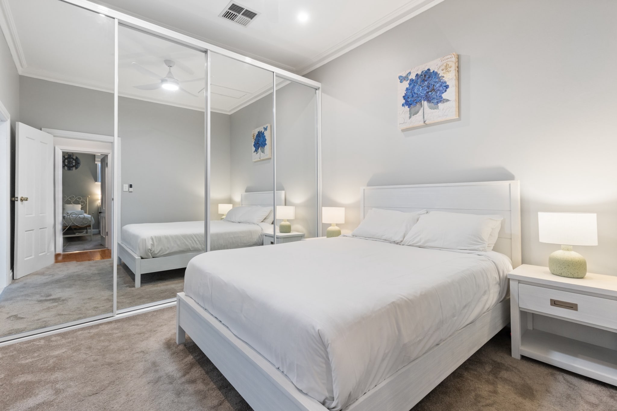 Immerse yourself in the charm of this heritage-inspired 4-bed, 2-bath house in North Adelaide. With stylish updates, ducted air conditioning, a private outdoor area & driveway parking, it's ideal for families or groups. Enjoy a short walk to cafés, shops, and parks. Just a 3-minute drive or 10-minute walk to Adelaide Oval for big footy games. Featuring Wi-Fi, self-check-in, and modern comforts, this character-filled home promises a comfortable and connected stay close to Adelaide's vibrant CBD.
The space
This spacious four-bedroom, two-bathroom home blends historic charm with modern comfort. Set in picturesque North Adelaide, the house exudes character with its heritage-inspired interiors, timber floors, and elegant furnishings. Each of the four bedrooms is fitted with quality bedding, blackout shutters, and ducted, reverse cycle heating and cooling & ceiling fans —ensuring restful nights for all guests. The main bedroom includes an ensuite for added privacy and convenience.


The living area invites relaxation with a plush two-and-a-half-seater couch, an occasional chair with stylish accents, a coffee table, and 3 TVs with free-to-air and streaming options (guests to use their own credentials). The open-plan dining and kitchen area is perfect for entertaining or enjoying home-cooked meals, with a fully equipped kitchen and generous storage. A large dining table seats six, while the countertop provides space for four more. Step outside through the lounge’s bi-fold doors to a tranquil private courtyard with a full set of outdoor furniture—ideal for alfresco dining or morning coffee.
Living Room
-Couch seats 2-3 people plus an occasional chair for relaxing

-3x TVs with free-to-air and streaming (guests to use their own credentials)

Kitchen & Dining Area
-Fully equipped with cutlery and utensils
-Oven and gas stovetop
-Dining area seats 6 and countertop seats 4
Bathroom & Laundry
-Laundry room available with washer and dryer
-Travel essentials, towels and hairdryer provided
Amenity Notes
-Onsite parking available in driveway for 2 cars
-Ducted A/C (heating + cooling) throughout
-Wi-Fi is available
-Study nook in bedroom 3
-The fireplace is for decoration purposes only
-Bi-fold doors open onto the entertainment area
-Private courtyard with outdoor seating
-BBQ is available