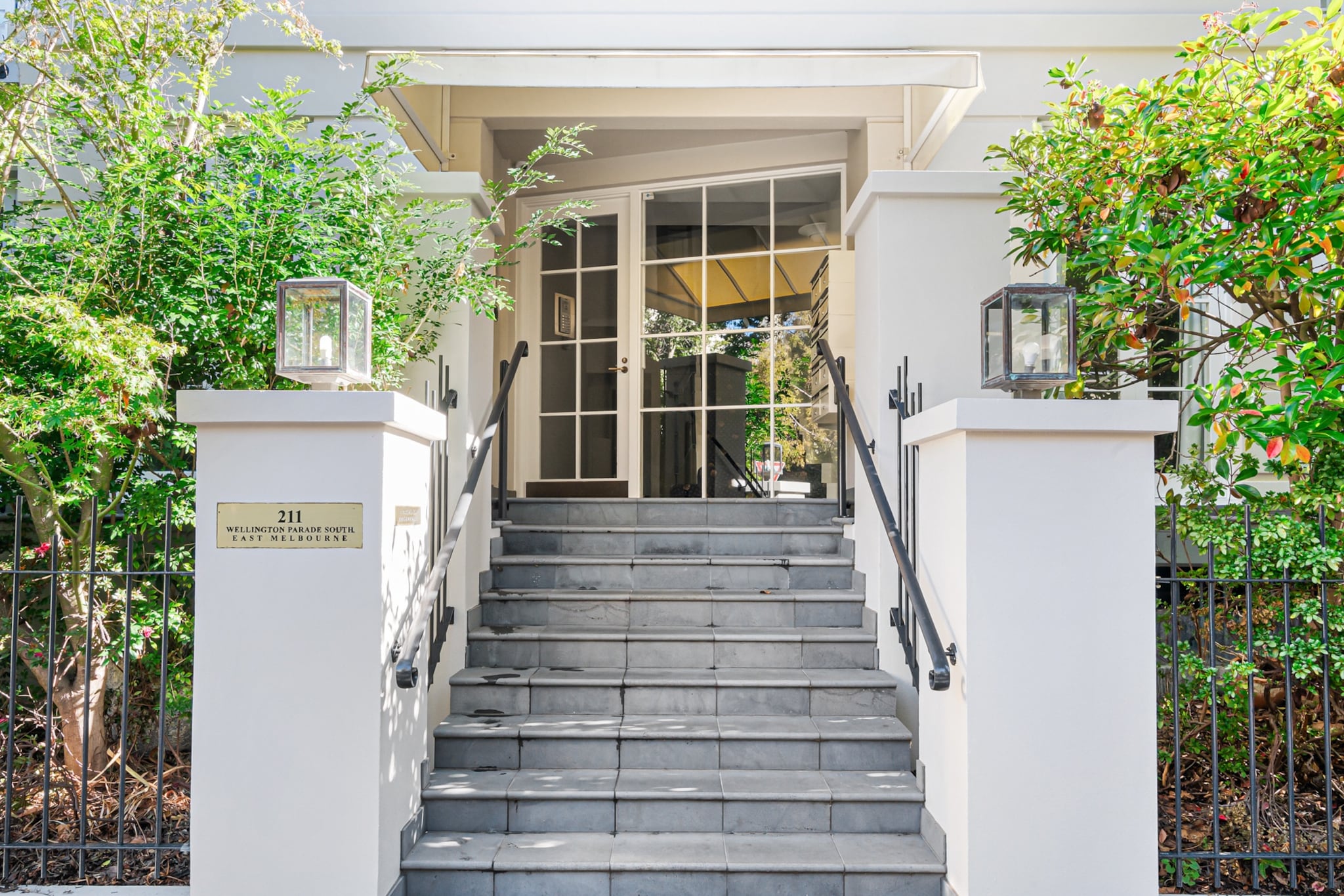 This modern 2-bedroom apartment in East Melbourne offers comfort and convenience, perfect for a relaxing stay. Featuring secure undercover parking and air conditioning, it promises a comfortable retreat. The open-plan living area includes a fully equipped kitchen with a gas stovetop, electric oven, and a dishwasher, while the living room offers a TV with free-to-air and streaming services. Explore the vibrant surroundings or unwind in style with everything you need for a memorable stay.
The space
This apartment boasts two spacious bedrooms; the master has a king bed with patio access, while the second bedroom has a queen bed. Both have bedside tables, lamps, and ample storage space. The living room is bright and comfortable, offering a TV with free-to-air channels and streaming services, alongside plush seating for relaxation. The open-plan kitchen is well-equipped with an electric oven, gas stovetop, and a dishwasher for easy dining. A cosy dining area seats six, complemented by additional countertop seating.
Living Room
- Couch seats 3 people + armchair
- TV with Free-to-Air channels and streaming services (guests to use their own credentials)
Kitchen & Dining Area
- Fully equipped with cutlery and utensils
- Electric oven and gas stovetop
- Dining area seats 4 (can be extended to accommodate 6 in total)
Bathroom & Laundry
- Laundry cupboard with washer, dryer, iron & ironing board and clothes airer
- Travel essentials, towels, and a hairdryer are provided
Amenity Notes
- Onsite undercover parking with 2.1m height clearance, 1 spot
- A/C (heating + cooling)in the living area
- Portable fans and heaters are available in the bedrooms
- Study nook in the living area
- Wi-Fi is provided
- Private outdoor area with a full set of outdoor furniture for 4
-The nearest tram stop is just minutes away on foot and within the free tram zone, with Flinders Street Station and Jolimont Station also within easy walking distance.