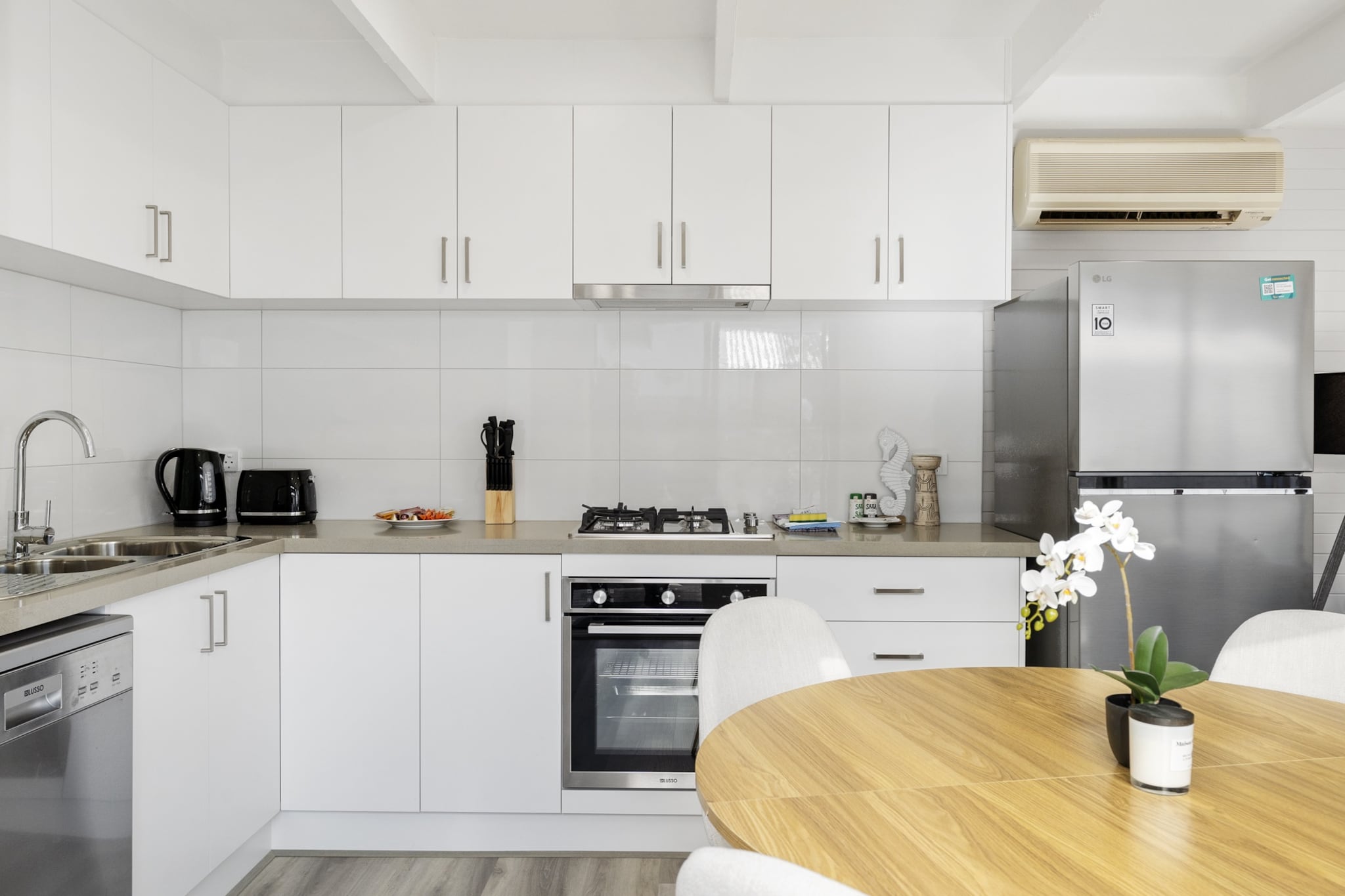 Enjoy a relaxing Rosebud stay in this inviting 2-bed unit with garden access and a BBQ area. Perfect for small families or friends, it features a fully equipped kitchen, a stylish living space, and onsite street parking. With Wi-Fi, washer/dryer, and a peaceful setting, this apartment ensures a comfortable, self-contained getaway just minutes from the coastline.
The space
Step into this thoughtfully arranged apartment that blends comfort with simplicity. The light-filled living space invites guests to unwind on the five-seater couch, framed by decorative touches, a soft rug, and a TV. Two serene bedrooms feature one queen and two double beds, with ample bedding and blackout blinds for restful sleep. A single bathroom services the space with modern fixtures and travel essentials. The kitchen comes fully stocked with cookware, an electric oven, and a gas stovetop, while a four-seater dining area offers a pleasant spot for meals. A dedicated laundry room with a washer and dryer combo completes the essentials for longer stays. Outside, guests can enjoy the back garden space, ideal for al fresco moments or a barbecue under the sun. A private entrance and street parking add ease to your arrival and departure. Whether you're relaxing after a beach day or enjoying a quiet evening in, this Rosebud home delivers comfort in a scenic coastal setting.
Living Room
-Two couches seat 5 people
-TV with streaming access (guests to use their own credentials)
Kitchen & Dining Area
-Fully equipped with cutlery and utensils
-Gas stovetop and electric oven
-Dining area seats 4
Bathroom & Laundry
-Laundry room available with washer and dryer combo
-Travel essentials, towels and hairdryer provided
Amenity Notes
-Street parking only
-A/C in the living area
-Portable heater in master bedroom
-Wi-Fi is available
-Back garden and BBQ area with seating for 4
Local area description
Located in the coastal town of Rosebud, this apartment is just moments from scenic beaches, boutique shops, and relaxing cafés. Enjoy local highlights like Rosebud Pier, Arthurs Seat Eagle, and Mornington Peninsula Hot Springs. The area offers a laid-back beach lifestyle with plenty of nearby nature trails and family-friendly attractions.
House rules
You are staying in a friendly and peaceful neighbourhood and we kindly ask you to respect the community and your surrounding neighbours. The following strict House Rules apply:
- No loud noise between 10 pm and 8 am
- No parties or antisocial behaviour
- No additional people are to access the property without our prior approval
- No pets are allowed in the property without approval
- No smoking is allowed at any times
- If you break something, please let us know
- To help protect all floor coverings, do not wear any shoes inside the property
Please be aware that excessive noise such as amplified music, vocals or screaming or anti-social behaviour in the property or common areas can cause neighbours to complain to us, the Building Manager, Council Rangers or Police.
IMPORTANT:
- Any breach of the House Rules may lead to a $500 fine plus compensation for any cost/damage created and immediate eviction of the property without refund.
- Pets are available on request unless the property states it is pet friendly. Any stays with pets will incur an additional cleaning fee of $200.
Finally, when checking out, we kindly ask you for the following:
- Please leave all beds unmade
- Please clean up your dishes and put them away
- In case you have rearranged furniture, please put it back to the original location
- Please take out the rubbish and remember to use the right bins
- Please ensure all appliances, A/C and lights are off and doors and windows are closed.
- Please check your accommodation thoroughly before departing to avoid any unintentional items left behind.
We are not liable for any items left behind after your stay. In the rare event that a guest reports a missing item, we will make every effort to locate it for you, but we cannot guarantee its retrieval. If the item is found, we will gladly assist in arranging its return to an address within Australia, subject to postage and service fees.
Interaction with guests
Welcome to MadeComfy! Our local team curates stays in exceptional Australian & New Zealand properties, ensuring style, comfort, and prime locations for discerning guests. We prioritise your needs to provide a memorable home-away-from-home experience. Explore our digital guidebooks for local recommendations, and don't hesitate to contact us throughout your stay. We're here to ensure your comfort - enjoy your stay with MadeComfy.
Notes
-Pets allowed upon approved requests; additional fees apply
For your comfort, this property is prepared with professional-grade hotel-style linen, including a three-sheet setup, ensuring a fresh and hygienic sleep experience.
Extra Services:
- Early Check-in: Our standard check-in is at 3 pm. To guarantee early access to the property we suggest booking the night before if available. Otherwise, early check-in is subject to availability from the night before at an additional cost.
- Late check-out: Our standard check-out is at 10 am. To guarantee a later check-out of the property we suggest booking an additional night if available. Otherwise, a late check-out is subject to availability from the night before to an additional cost.
- Baggage: For security reasons, we are unable to receive or to keep unattended baggage before check-in or after check-out
- We provide a small welcome amenity pack to get your stay started.
- This booking is protected with coverage for lost baggage and emergency medical expenses, provided by Travel Support with claim upto 500 AUD (T&C Applies). For more details reach out to Guest Support team post booking.
Access description
Key collection is onsite. Further details will be provided 3 days before check-in if your booking is successfully reserved.
Getting around
Public Transport
Local buses run through Rosebud with stops along Point Nepean Rd. Nearest train stations are in Frankston, approx. 50 min drive.
Getting There
Rosebud is approx. 90 km (1 hr 30 min) drive from Melbourne CBD. Melbourne Airport is a 1 hr 45 min drive away.