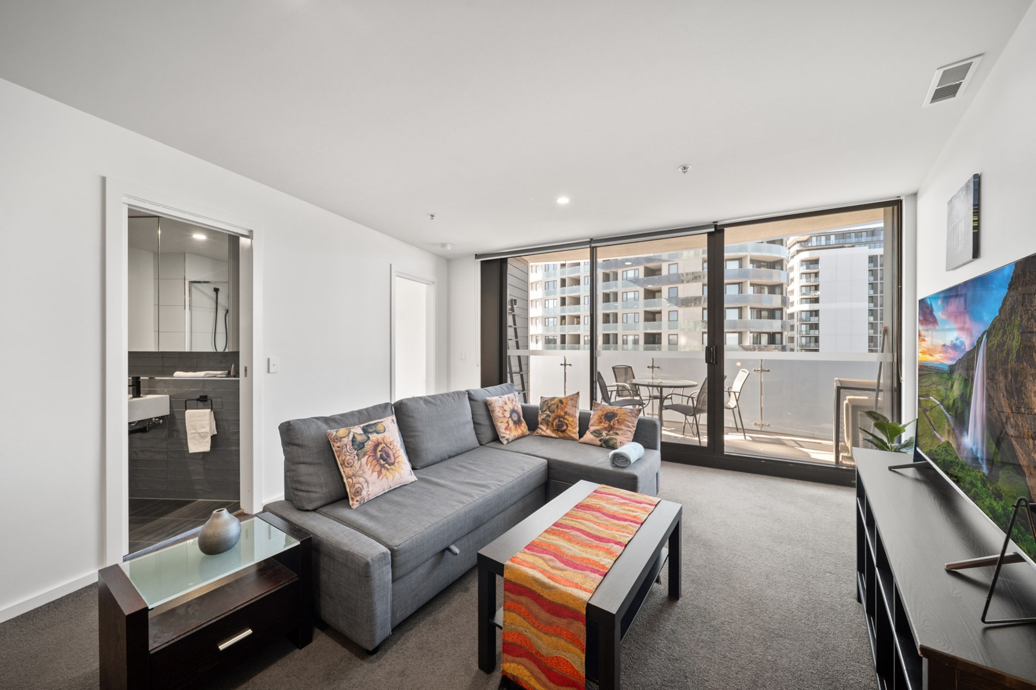 Enjoy a convenient Gungahlin stay in this bright 1-bedroom apartment. With modern amenities, a private balcony, undercover parking, and access to a communal pool, gym and BBQ, it's ideal for leisure or work. Self-check-in available for added ease.
The space
This inviting apartment features a sleek open-plan living and dining area with a comfortable couch that also functions as a pull-out sofa bed. Natural light pours in from floor-to-ceiling windows that lead to a fully furnished private balcony—ideal for relaxing or enjoying meals outdoors. The double bedroom includes blackout blinds and two bedside tables with lamps for added comfort. A modern bathroom is complemented by a laundry room with washer/dryer for your convenience. The well-appointed kitchen offers electric cooking, a dishwasher, and all essential cookware. With plush carpeted flooring, a coffee machine, and split system air conditioning in the living area, this space combines comfort and practicality. Guests also enjoy access to communal facilities including an outdoor pool, gym, and BBQ area, all located on level 5.
Living Room
-Couch (also a pull-out sofa bed) seats 3 people
-TV with Free-to-Air and streaming (guests to use their own credentials)
Kitchen & Dining Area
-Fully equipped with cutlery and utensils
-Electric stovetop and electric oven
-Dining area seats 3
Bathroom & Laundry
-Laundry area available with washer/dryer combo
-Travel essentials, towels and hairdryer provided
Amenity Notes
-Parking: Onsite undercover parking for 1 car (2.1m height limit)
-Air Conditioning: Split system (heating + cooling) in the living area
-Portable fan in the bedroom
-Wi-Fi is available
-Private Amenities: Balcony with full outdoor furniture set for 4
-Building Amenities: Access to communal gym, outdoor pool, and BBQ on Level 5
Local area description
Located just 13km north of Canberra’s CBD, Gungahlin is a vibrant and fast-growing suburb offering the perfect blend of convenience and lifestyle. Well connected by Canberra’s light rail and major roadways, it’s easy to explore the city from here. Guests will enjoy a wide range of cafes, restaurants, and major retailers at Gungahlin Town Centre, along with leafy parks, walking trails, and family-friendly amenities. With a strong community feel and everything you need close by, Gungahlin is an ideal base for both short and extended stays in the nation’s capital.
House rules
You are staying in a friendly and peaceful neighbourhood and we kindly ask you to respect the community and your surrounding neighbours. The following strict House Rules apply:
- No loud noise between 10 pm and 8 am
- No parties or antisocial behaviour
- No additional people are to access the property without our prior approval
- No pets are allowed in the property without approval
- No smoking is allowed at any times
- If you break something, please let us know
- To help protect all floor coverings, do not wear any shoes inside the property
Please be aware that excessive noise such as amplified music, vocals or screaming or anti-social behaviour in the property or common areas can cause neighbours to complain to us, the Building Manager, Council Rangers or Police.
IMPORTANT:
- Any breach of the House Rules may lead to a $500 fine plus compensation for any cost/damage created and immediate eviction of the property without refund.
- Pets are available on request unless the property states it is pet friendly. Any stays with pets will incur an additional cleaning fee of $200.
Finally, when checking out, we kindly ask you for the following:
- Please leave all beds unmade
- Please clean up your dishes and put them away
- In case you have rearranged furniture, please put it back to the original location
- Please take out the rubbish and remember to use the right bins
- Please ensure all appliances, A/C and lights are off and doors and windows are closed.
- Please check your accommodation thoroughly before departing to avoid any unintentional items left behind.
We are not liable for any items left behind after your stay. In the rare event that a guest reports a missing item, we will make every effort to locate it for you, but we cannot guarantee its retrieval. If the item is found, we will gladly assist in arranging its return to an address within Australia, subject to postage and service fees.
Interaction with guests
Welcome to MadeComfy! Our local team curates stays in exceptional Australian & New Zealand properties, ensuring style, comfort, and prime locations for discerning guests. We prioritise your needs to provide a memorable home-away-from-home experience. Explore our digital guidebooks for local recommendations, and don't hesitate to contact us throughout your stay. We're here to ensure your comfort - enjoy your stay with MadeComfy.
Notes
For your comfort, this property is prepared with professional-grade hotel-style linen, including a three-sheet setup, ensuring a fresh and hygienic sleep experience.
Extra Services:
- Early Check-in: Our standard check-in is at 3 pm. To guarantee early access to the property we suggest booking the night before if available. Otherwise, early check-in is subject to availability from the night before at an additional cost.
- Late check-out: Our standard check-out is at 10 am. To guarantee a later check-out of the property we suggest booking an additional night if available. Otherwise, a late check-out is subject to availability from the night before to an additional cost.
- Baggage: For security reasons, we are unable to receive or to keep unattended baggage before check-in or after check-out
- We provide a small welcome amenity pack to get your stay started.
- This booking is protected with coverage for lost baggage and emergency medical expenses, provided by Travel Support with claim upto 500 AUD (T&C Applies). For more details reach out to Guest Support team post booking.
Access description
The key collection is located offsite (941m away from the property) and not available 24/7. Further details will be provided 3 days before check-in if your booking is successfully reserved.
Getting around
Public Transport
Close to Gungahlin Place light rail station and local bus stops offering access to central Canberra.
Getting There
About 20 mins drive from Canberra Airport and 25 mins from Canberra CBD.