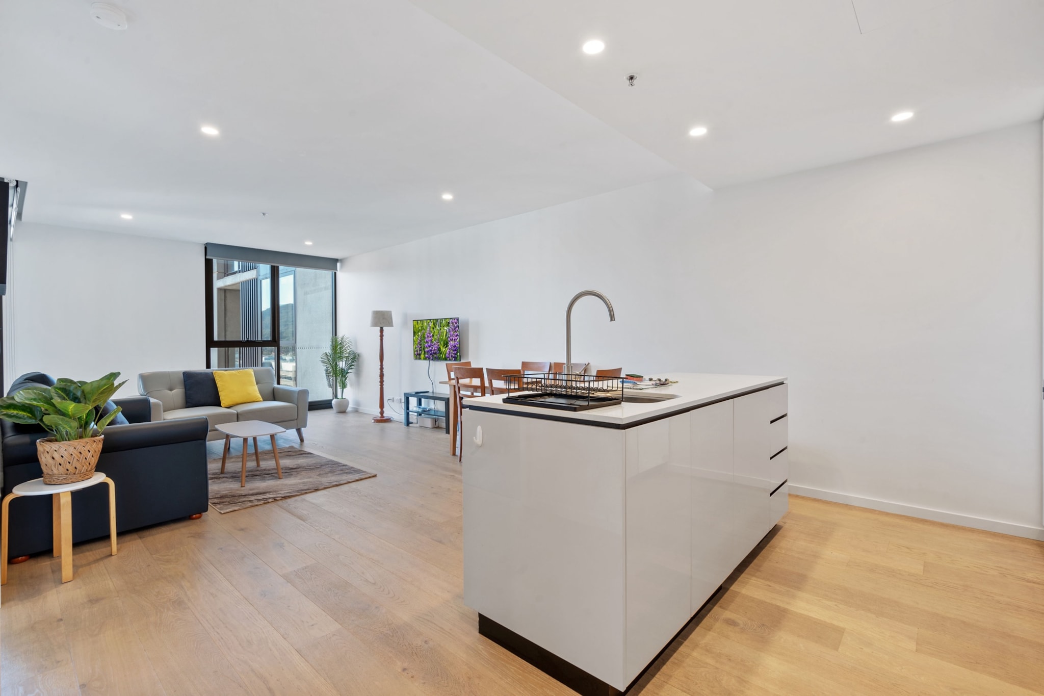 Experience comfort in this sleek 1-bed apartment in central Canberra, offering secure parking, a balcony with outdoor furniture, and ducted air conditioning throughout. Enjoy self-check-in, modern furnishings, and access to the on-site gym and sauna. Perfect for business or leisure stays with proximity to shops, universities, and parliament.
The space
Step into this light-filled, thoughtfully styled apartment nestled in the heart of Canberra. The living area features a timber-look hardwood floor, a comfortable two-seater couch, and a Smart TV offering Free-to-Air channels and streaming access. A private balcony, accessible from both the living room and bedroom, invites relaxation with its full outdoor furniture setup. The bedroom features a double bed, bedside tables and lamps, and blackout blinds, promising restful nights. The kitchen is fully equipped with modern appliances, including an electric stove and oven, dishwasher, microwave, and coffee machine. The dining area comfortably seats six guests, making it ideal for meals or work. A private laundry room next to the bathroom includes a washer, dryer, ironing board, and drying rack. Ducted reverse-cycle air conditioning provides comfort year-round across both the living and bedroom spaces. Guests will also enjoy access to building amenities like the gym and sauna located on level one. This apartment blends functionality and style, catering to both business travellers and holidaymakers.
 
Living Room
- Couch seats 2 people
- TV with Free-to-Air and streaming access (guests to use their own credentials)
 
Kitchen & Dining Area
- Fully equipped with cutlery, and utensils
- Electric stovetop and oven
- Dining area seats 6
 
Bathroom & Laundry
- Laundry room available with washer and dryer
- Travel essentials, towels and hairdryer provided
 
Amenity Notes
- Onsite parking in underground garage, 1 space, 2.2m clearance
- Ducted A/C (heating + cooling) throughout
- Wi-Fi is available
- Private Amenities: Balcony with full outdoor furniture
- Building Amenities: Gym and sauna access
Local area description
Located in Canberraâ€™s bustling centre, the apartment offers easy access to the city's cultural and political landmarks. Parliament House, the National Gallery, and the Australian National University are all nearby. Enjoy lively cafÃ©s, retail shops, and scenic walking trails around Lake Burley Griffin just moments away.
House rules
You are staying in a friendly and peaceful neighbourhood and we kindly ask you to respect the community and your surrounding neighbours. The following strict House Rules apply:
 
- No loud noise between 10 pm and 8 am
- No parties or antisocial behaviour
- No additional people are to access the property without our prior approval
- No pets are allowed in the property without approval
- No smoking is allowed at any times
- If you break something, please let us know
- To help protect all floor coverings, do not wear any shoes inside the property
 
Please be aware that excessive noise such as amplified music, vocals or screaming or anti-social behaviour in the property or common areas can cause neighbours to complain to us, the Building Manager, Council Rangers or Police.
 
IMPORTANT:
- Any breach of the House Rules may lead to a $500 fine plus compensation for any cost/damage created and immediate eviction of the property without refund.
- Pets are available on request unless the property states it is pet friendly. Any stays with pets will incur an additional cleaning fee of $200.
 
Finally, when checking out, we kindly ask you for the following:
 
- Please leave all beds unmade
- Please clean up your dishes and put them away
- In case you have rearranged furniture, please put it back to the original location
- Please take out the rubbish and remember to use the right bins
- Please ensure all appliances, A/C and lights are off and doors and windows are closed.
- Please check your accommodation thoroughly before departing to avoid any unintentional items left behind.
 
We are not liable for any items left behind after your stay. In the rare event that a guest reports a missing item, we will make every effort to locate it for you, but we cannot guarantee its retrieval. If the item is found, we will gladly assist in arranging its return to an address within Australia, subject to postage and service fees.
Interaction with guests
Welcome to MadeComfy! Our local team curates stays in exceptional Australian & New Zealand properties, ensuring style, comfort, and prime locations for discerning guests. We prioritise your needs to provide a memorable home-away-from-home experience. Explore our digital guidebooks for local recommendations, and don't hesitate to contact us throughout your stay. We're here to ensure your comfort - enjoy your stay with MadeComfy.
Notes
For your comfort, this property is prepared with professional-grade hotel-style linen, including a three-sheet setup, ensuring a fresh and hygienic sleep experience.
 
Extra Services:
- Early Check-in: Our standard check-in is at 3 pm. To guarantee early access to the property we suggest booking the night before if available. Otherwise, early check-in is subject to availability from the night before at an additional cost.
- Late check-out: Our standard check-out is at 10 am. To guarantee a later check-out of the property we suggest booking an additional night if available. Otherwise, a late check-out is subject to availability from the night before to an additional cost.
- Baggage: For security reasons, we are unable to receive or to keep unattended baggage before check-in or after check-out
- We provide a small welcome amenity pack to get your stay started.
- This booking is protected with coverage for lost baggage and emergency medical expenses, provided by Travel Support with claim upto 500 AUD (T&C Applies). For more details reach out to Guest Support team post booking.
Access description
The key collection is located offsite and not available 24/7. Further details will be provided 3 days before check-in if your booking is successfully reserved.
Getting around
Public Transport
Multiple bus stops along London Circuit are just steps away. Canberraâ€™s light rail connects nearby suburbs with the city centre.
 
Getting There
Canberra Airport is a 15-min drive (9km) from the property. The apartment is located directly in Canberra CBD.