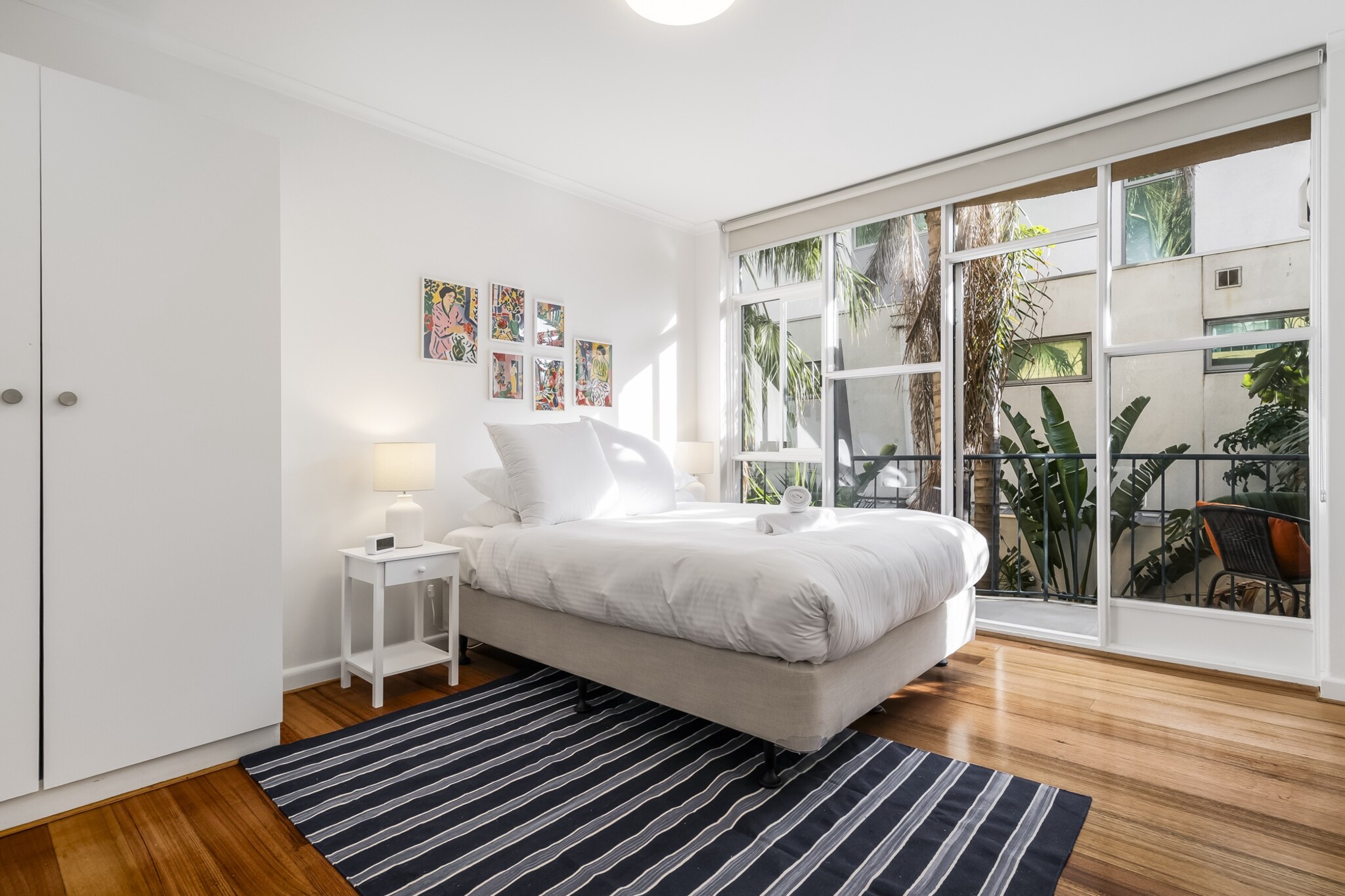 Steps from the beach, this bright one-bedroom apartment offers a relaxed St Kilda stay with coastal charm. Featuring a private balcony, smart TV, fully equipped kitchen, and permit street parking, it’s ideal for couples or solo travellers. Enjoy a peaceful atmosphere just moments from cafés, trams, and the iconic Luna Park. Self check-in via lockbox for added convenience.
The space
This sunlit first-floor apartment invites you into a warm and coastal-inspired retreat, perfect for unwinding by the bay. The living area features timber floors, a plush two-seater couch, smart TV, and charming styling with touches of greenery. The queen bedroom offers blackout blinds and direct access to a private balcony furnished with a full outdoor setting—ideal for relaxed mornings or evening breezes.
The kitchen is fully stocked with essentials, including an electric oven and stovetop, coffee machine, and a complete cookware set, while the compact breakfast bar seats two for casual dining. The sleek bathroom is ensuite-style and fitted with modern finishes, complemented by a communal laundry room nearby.
Soft lighting, practical comforts, and thoughtful styling combine to make this a relaxing base in one of Melbourne’s most iconic suburbs.
Living Room
- Couch seats 2 people
- TV with streaming access
Kitchen
- Fully equipped with cutlery and utensils
- Electric stovetop and electric oven
- Countertop seats 2
Bathroom & Laundry
- Communal laundry room available with coin-operated washer and dryer
- Travel essentials, towels and hairdryer provided