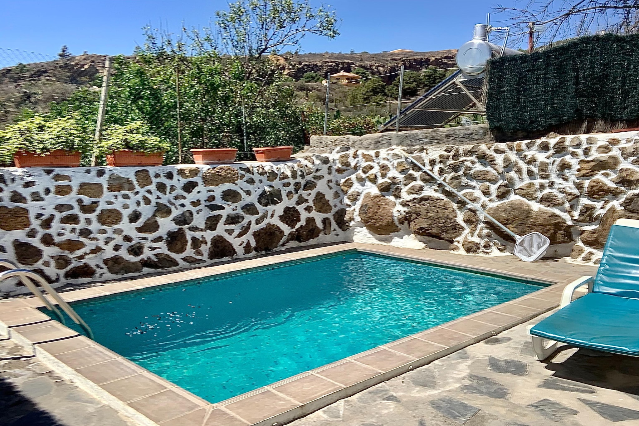 Escape to a peaceful corner of Tenerife at this charming rural home in Granadilla de Abona—an ideal retreat for up to four guests. Set in the romantic and leafy hamlet of Las Vegas, this cottage offers the perfect balance between nature, comfort, and authenticity. Far from the bustle of Playa de las Américas yet close to essential facilities, it’s a place where quiet mornings, starry nights, and pure island air create a truly restorative stay.

Inside, the home features two welcoming bedrooms—one with a double bed and another with bunk beds or two single beds—making it perfect for couples, friends or small families. The bright living/dining room invites you to relax with a satellite TV, DVD player, and a cozy seating area that opens onto the terrace. The fully equipped kitchen comes with everything you need for easy home-cooked meals: hob, oven, microwave, coffee machine, dishwasher, fridge-freezer and a dining table for shared breakfasts before heading out to explore. A modern bathroom with a shower and hairdryer completes the indoor comfort, while the dedicated laundry room with a washer, dryer and ironing facilities makes longer stays effortless.

Step outside to enjoy your private terrace with garden furniture and a BBQ ideal for long, laid-back evenings under the Tenerife sky. The highlight is your own private swimming pool, open year-round, where you can cool off, sunbathe, and soak in the serenity of the surrounding green landscape. With private parking and an alarm system for peace of mind, this rural hideaway is as practical as it is charming.

Whether you’re hiking through the lush trails of the Güímar Valley, discovering volcanic landscapes, exploring nearby villages, or driving to Tenerife’s beaches, this home is a perfect base for an unforgettable island escape.