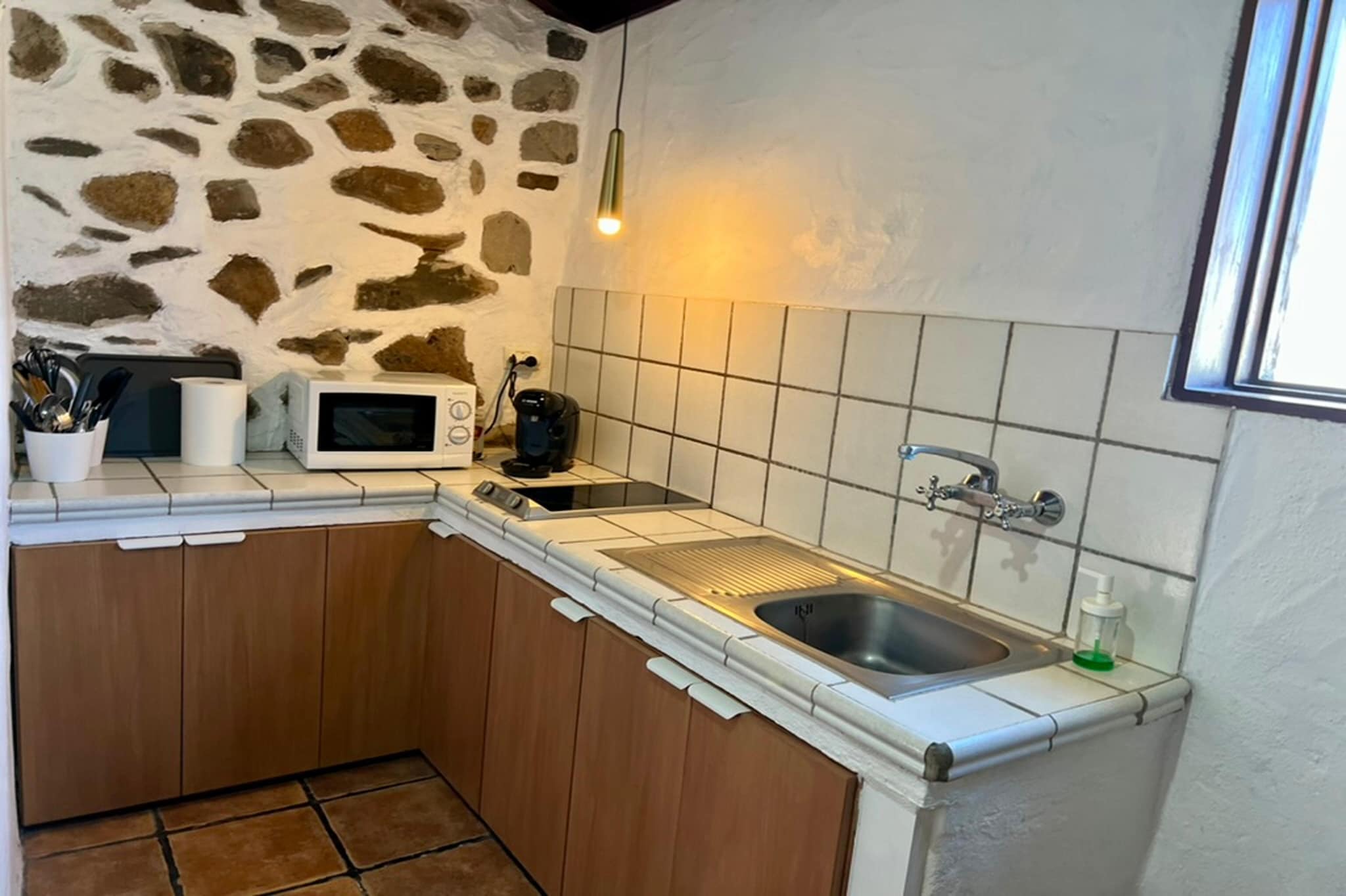 Ground floor: (Entrance(reachable from the outside), Kitchen(dining table, hob, hood, coffee machine, oven, microwave, dishwasher, fridge-freezer), Living/diningroom(TV(flatscreen, satellite, digital), seating area, DVD player, balcony or terrace), bedroom(double bed(135 x 190 cm)), bedroom(bunk bed or 2 single beds), bedroom(single bed(90 x 190 cm), single bed(90 x 190 cm)), bathroom(washbasin, toilet, hairdryer))\n\nwashing room(tumble dryer, washing machine, ironing board, iron), garden doors, terrace, garden(private), garden furniture, BBQ, swimming pool(private, outside, 7 x 3 m., opened from Jan upto and including Dec), Alarm