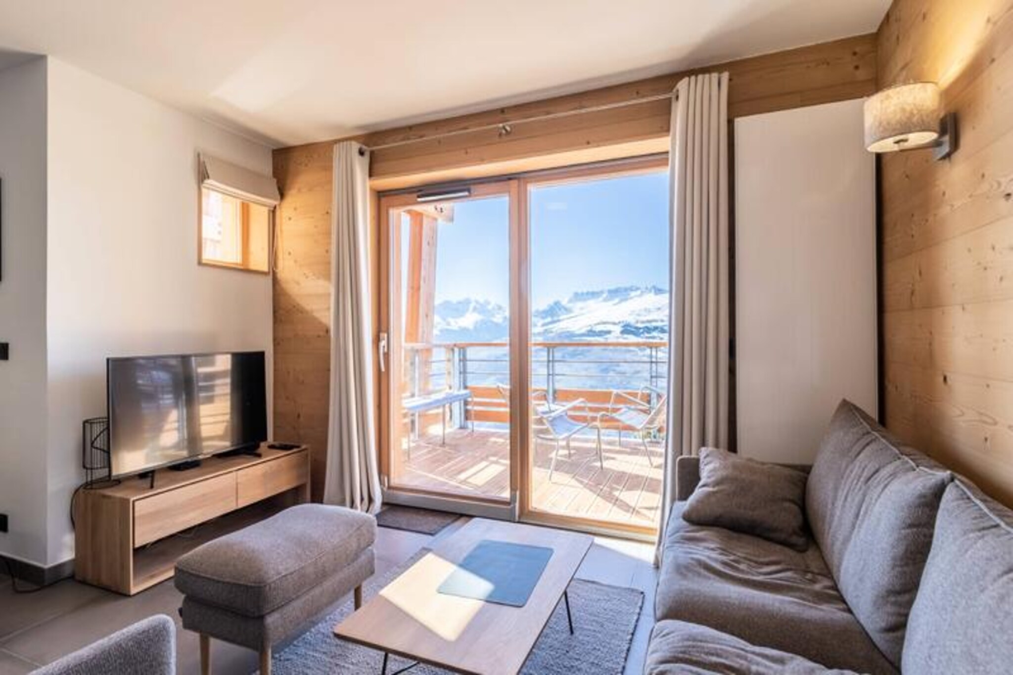 In the vibrant Villards district of Les Arcs 1800, this luxurious 4-star apartment offers a serene retreat with breathtaking views of the Tarentaise Valley. Perched on the fifth floor of the prestigious L’Écrin residence, this 80m² haven is bathed in natural light and boasts a west-facing terrace perfect for soaking in the alpine sunsets. The property combines modern elegance with mountain charm, making it an ideal choice for families and groups seeking both comfort and adventure in the heart of the French Alps. Rated 4 Paradiski Crystals, it guarantees a high standard of quality and refinement. \n\nThe apartment comfortably accommodates up to six adults and two children, with three thoughtfully designed bedrooms. The master bedroom features a double bed, a private terrace, and an en-suite shower room. The second bedroom offers twin beds, while the third includes two sets of bunk beds, perfect for younger guests. The open-plan living area is a welcoming space to relax, complete with a non-convertible sofa, dining table, and a fully equipped kitchen featuring modern appliances such as an induction hob, dishwasher, and coffee makers. Additional amenities include Wi-Fi, a washer-dryer, ski locker, and access to the residence's wellness area with a sauna, hammam, and fitness room.\n\nLocated just a two-minute walk from the slopes and ski schools, this apartment is a dream for winter sports enthusiasts. In summer, the area transforms into a paradise for outdoor lovers, offering mountain biking, hiking, paragliding, and even an aquatic center nearby. The vibrant village atmosphere of Les Arcs is complemented by its array of restaurants, shops, and activities, ensuring entertainment for all ages. Whether you’re here to carve through fresh powder or explore the scenic trails of the Vanoise National Park, this property offers the perfect base for unforgettable alpine adventures.\n\nWith its prime location, premium amenities, and stunning surroundings, this apartment invites you to experience the magic of Les Arcs 1800 in every season. Let the mountains inspire your next getaway.