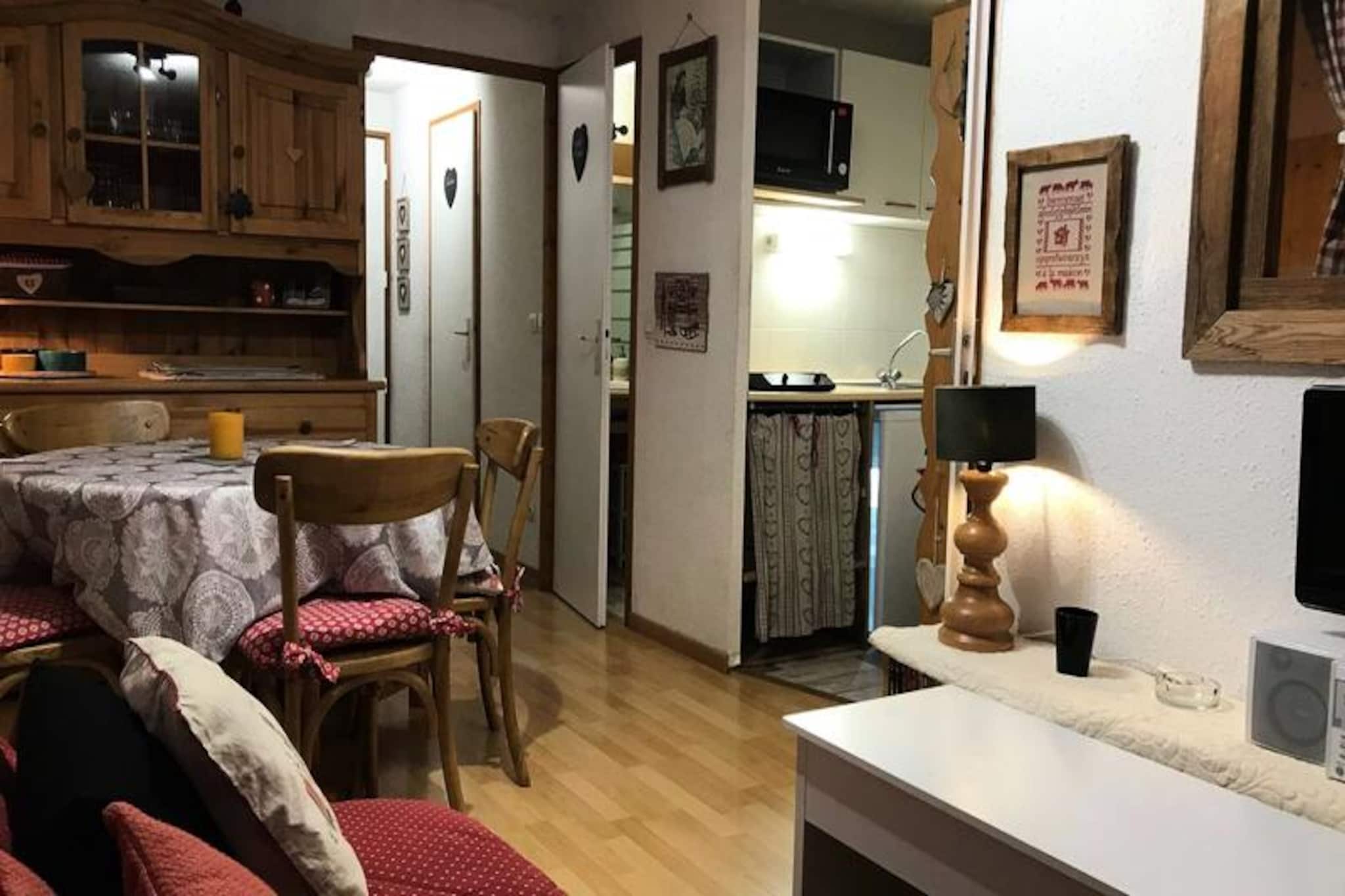 In the heart of a charming alpine village, this cozy and functional 27m² apartment offers a delightful retreat for up to four guests. With its prime location just steps from the ski slopes and surrounded by the vibrant village atmosphere, it’s the perfect base for both winter and summer adventures. Imagine waking up to the crisp mountain air, stepping onto your east-facing balcony with a cup of coffee, and soaking in the stunning views of the village and surrounding peaks. During the summer months, a private swimming pool adds an extra touch of relaxation to your stay. \n\nThe apartment is thoughtfully designed to maximize comfort and convenience. The entrance features a closed cabin with two single bunk beds, ideal for children or friends. The living area is bright and inviting, complete with a double sofa, TV, and a well-equipped kitchenette that includes a dishwasher. A separate cozy bedroom with a double bed ensures restful nights, while the bathroom and separate toilet add practicality to the layout. The balcony, furnished with garden seating, is perfect for enjoying meals or simply unwinding after a day of exploration. Additional amenities include free parking, an elevator, and optional services such as linen rental and discounted ski passes.\n\nBeyond the apartment, the village offers a wealth of activities and attractions. In winter, the proximity to the ski slopes makes it a haven for snow enthusiasts, while summer transforms the area into a paradise for hikers and nature lovers. Nearby shops, restaurants, and cultural events ensure that your stay is as lively or as tranquil as you desire. Whether you’re here for the thrill of skiing or the serenity of alpine summers, this apartment promises a memorable getaway in the heart of the French Alps.