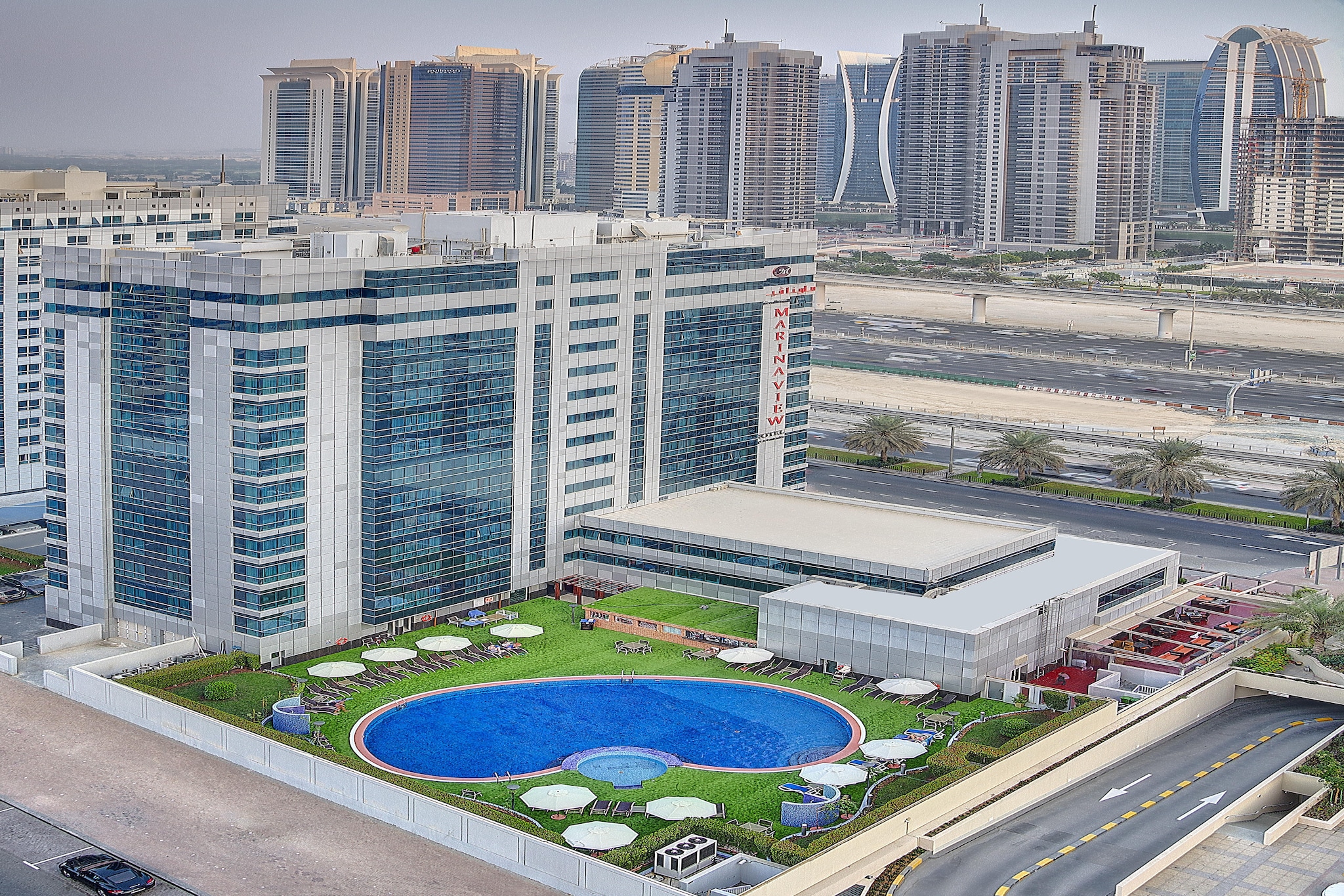 Experience elevated comfort and modern luxury at Sunday Marina View Hotel Apartment, a stylish urban retreat built in 2010 and perfectly located for business and leisure travelers. Enjoy a seamless stay with 24-hour front desk service, free Wi-Fi throughout the property, and round-the-clock security for your peace of mind.
Our elegantly designed rooms and apartments feature plush twin beds, city views, and premium amenities including air conditioning, a flat-screen TV, a private bathroom with deluxe toiletries, and a fully equipped kitchenette. Guests can unwind in the outdoor pool, relax at the shared lounge, or savor a meal at our on-site restaurant.
Daily housekeeping, room service, and business facilities ensure both comfort and convenience. Paid airport and shuttle transfers are available for effortless travel. Whether you’re here for work or relaxation, Sunday Marina View Hotel Apartment offers the perfect blend of sophistication and hospitality.