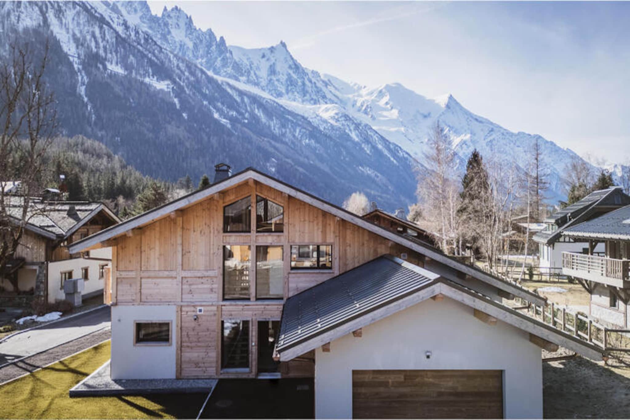 Amidst the serene alpine beauty of Les Tines, this magnificent 150m² chalet offers an unforgettable retreat for up to 10 guests. With breathtaking views of the Mont Blanc massif and the Drus mountains, every moment here feels like a postcard come to life. Whether you’re seeking adventure or tranquility, this chalet provides the perfect setting to immerse yourself in the magic of the French Alps. Just 1.8 km from the Flégère ski area and 4.6 km from the lively shops of Chamonix, it combines convenience with unparalleled natural splendor. Nearby bus and train stops, only 350 meters away, ensure easy access to the region’s wonders. \n\nDesigned with comfort and elegance in mind, the chalet spans three levels. On the ground floor, you’ll find three en-suite double bedrooms, a family room with bunk beds and a double bed, and a ski room to store your equipment after a day on the slopes. The first floor is the heart of the home, featuring a fully equipped kitchen, a cozy lounge with a fireplace, and a dining area that opens onto a terrace with stunning mountain views. The mezzanine on the second floor offers a quiet office space, perfect for those seeking a moment of solitude or inspiration. Modern amenities such as a laundry room, wine cooler, and Nespresso coffee maker ensure a seamless stay. \n\nStep outside to discover the chalet’s outdoor jacuzzi, where you can unwind under the stars after a day of skiing or hiking. With a double garage, three outdoor parking spaces, and pet-friendly accommodations, this property caters to every need. The included services, such as linens, bathroom products, and end-of-stay cleaning, ensure a hassle-free experience, while optional extras like additional cleaning and linen changes are available upon request. \n\nWhether you’re exploring the slopes of Flégère, wandering the charming streets of Chamonix, or simply soaking in the panoramic views, this chalet is your gateway to the ultimate alpine escape. Let the majestic Mont Blanc massif be the backdrop to your unforgettable holiday.