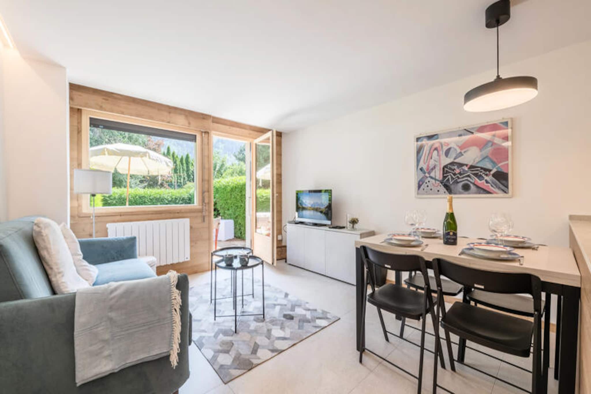 In the heart of the majestic Chamonix Valley, this charming ground-floor apartment in Les Praz offers a tranquil retreat for couples or small families. With its private garden and terrace, you’ll wake up to awe-inspiring views of Les Drus and the Aiguille Verte, a perfect backdrop for your alpine escape. Whether you’re sipping your morning coffee or enjoying an evening under the stars, the serene ambiance of this location will leave you enchanted. \n\nThe apartment spans 38 m² and is thoughtfully designed to provide both comfort and functionality. The cozy double bedroom ensures restful nights, while the bright living room, complete with a sofa bed and flat-screen TV, invites relaxation after a day of adventure. The fully equipped kitchen, featuring modern appliances like an induction hob, oven, and Nespresso machine, makes it easy to prepare meals to enjoy indoors or on the terrace. Additional conveniences such as a washing machine, heated towel rail, and Wi-Fi enhance your stay, ensuring a seamless experience.\n\nSituated just 170 meters from bus and train stops, the property offers excellent connectivity to Chamonix’s renowned attractions. Explore world-class ski slopes, hiking trails, and the vibrant town center, all within easy reach. After a day of exploring, store your gear in the private ski storage and unwind in the comfort of your alpine haven. \n\nWith its blend of modern amenities, breathtaking scenery, and prime location, this apartment is an ideal choice for those seeking a memorable getaway in the French Alps. Let the beauty of Chamonix inspire your next adventure.