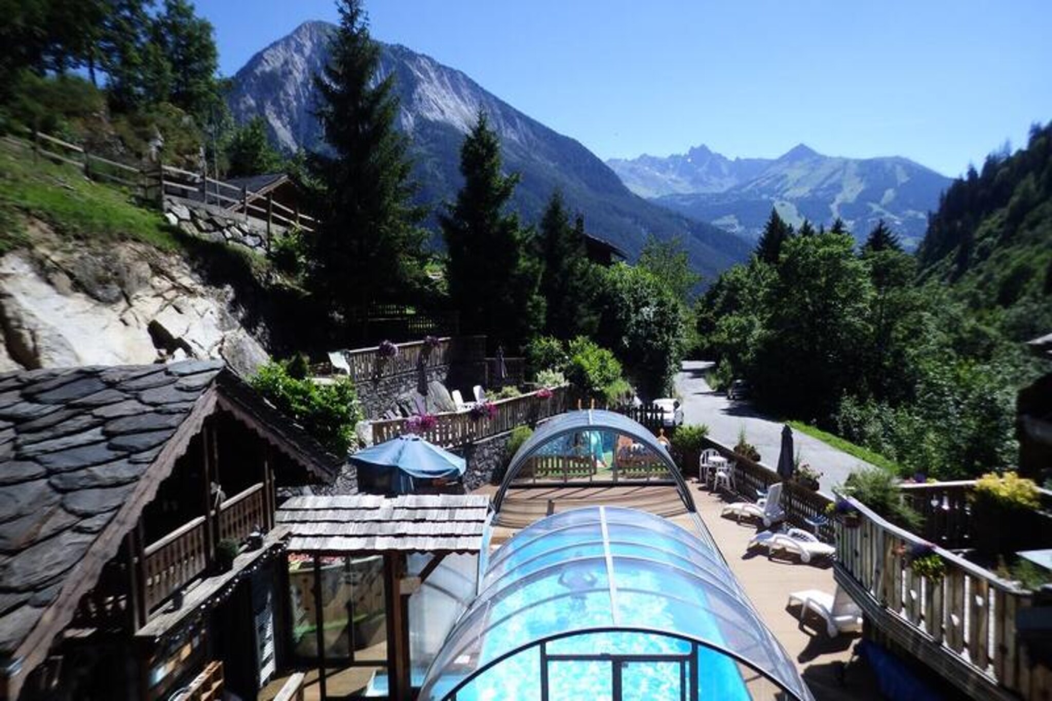 At the edge of the picturesque village of Champagny-en-Vanoise, where the majestic peaks of the Vanoise National Park rise dramatically against the sky, lies the charming Les Edelweiss Residence. This idyllic retreat, with its traditional stone and wood chalets crowned by slate roofs, invites you to experience the perfect blend of alpine authenticity and modern comfort. The warm, wood-paneled interiors exude a cozy atmosphere that will make you feel at home from the moment you arrive.
The residence offers a range of amenities designed to enhance your stay. Dive into the semi-covered heated swimming pool, open from July to September, or unwind in the communal sauna after a day of outdoor adventures. For those seeking a bit of friendly competition, the tennis court and pétanque court provide the perfect setting. Each accommodation is equipped with Wi-Fi and a television, ensuring you stay connected and entertained throughout your visit.
Champagny-en-Vanoise is a haven for outdoor enthusiasts. Explore the countless hiking trails that lead to breathtaking summits and hidden mountain huts, or challenge yourself with climbing, via ferrata, and thrilling mountain biking routes. The village itself offers a welcoming atmosphere with local charm, making it an ideal base for discovering the wonders of the French Alps.
Whether you’re seeking adventure or relaxation, Les Edelweiss Residence is your gateway to an unforgettable alpine escape. With its prime location, excellent facilities, and stunning surroundings, it promises a holiday filled with cherished memories.