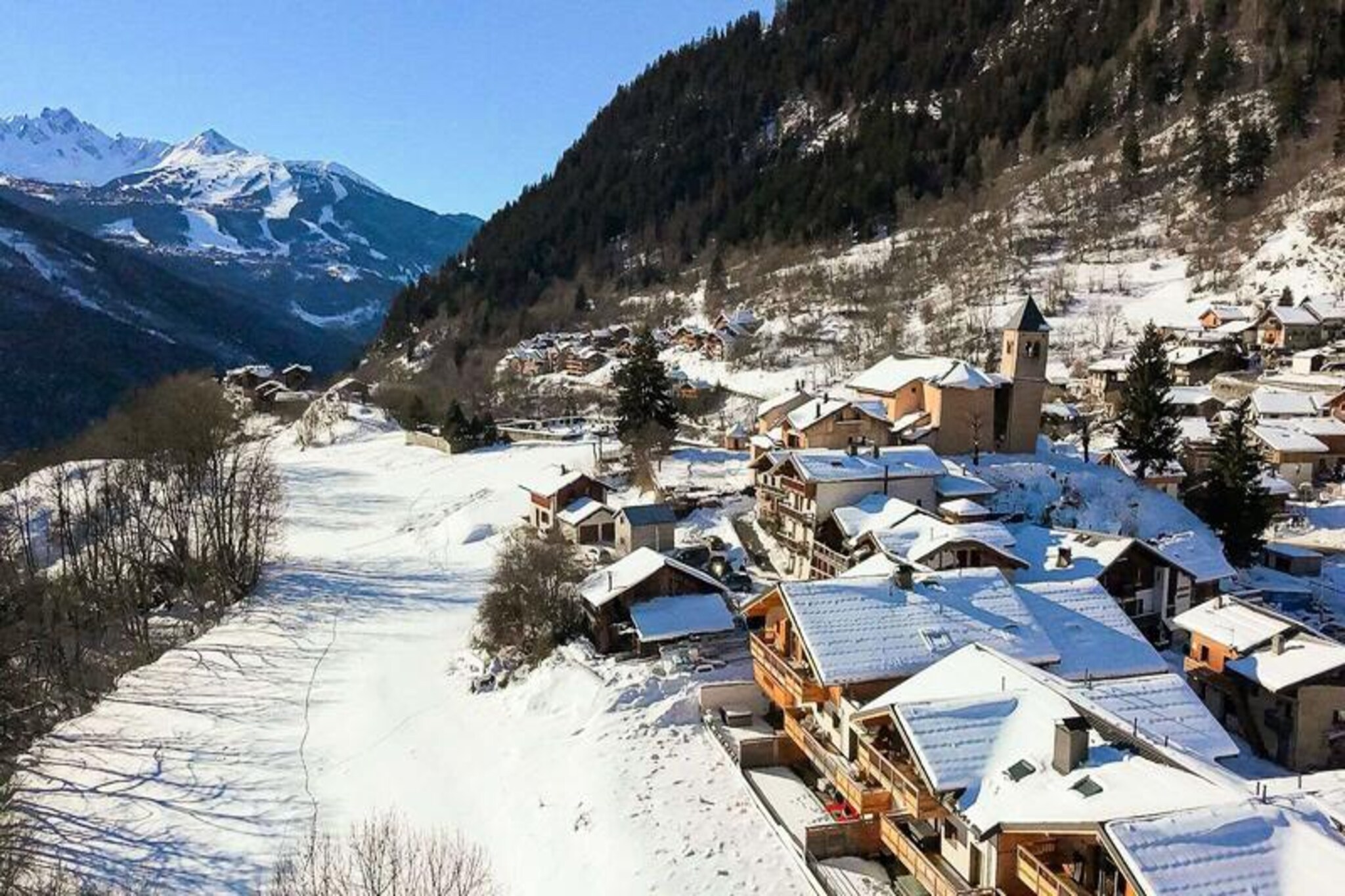 Elevated above the picturesque hamlet of Villard Dessous, this modern and elegant apartment in the Terrasses de la Vanoise residence offers a luxurious alpine retreat with breathtaking views of the majestic Vanoise mountains. Situated opposite the charming village of Champagny en Vanoise, the property blends contemporary comfort with the timeless beauty of the French Alps, creating a perfect haven for relaxation and adventure alike. Whether you’re visiting in winter or summer, the serene surroundings and thoughtful design of this residence promise an unforgettable stay. \n\nThe apartment, rated 4 stars, spans 75 square meters and is thoughtfully designed to accommodate up to six guests. It features a master suite with a double bed and en-suite bathroom, a second bedroom with versatile twin beds that can be joined, and a cozy sleeping alcove with bunk beds. The open-plan kitchen is fully equipped with modern appliances, including a Nespresso machine and induction hob, making it ideal for preparing meals to enjoy in the dining area. The living room opens onto a north-west-facing balcony, perfect for soaking in the alpine views. Additional amenities include Wi-Fi, a washer-dryer, a ski locker with boot dryer, and two private parking spaces. Hotel services such as bed linen, towels, and end-of-stay cleaning are included, ensuring a seamless and comfortable experience. \n\nLocated just 500 meters from shops and ski lifts, the residence offers easy access to the village’s amenities, including free municipal shuttles running every 30 minutes during high season. In summer, guests can enjoy proximity to the swimming pool and spa, as well as hiking trails and outdoor adventures in the surrounding mountains. The nearby Champagny-le-Haut area and Vanoise National Park provide endless opportunities for exploration and discovery. \n\nWhether you’re seeking thrilling ski days, tranquil summer hikes, or simply a peaceful escape in the heart of the Alps, this exceptional property delivers the perfect blend of comfort, convenience, and natural beauty.