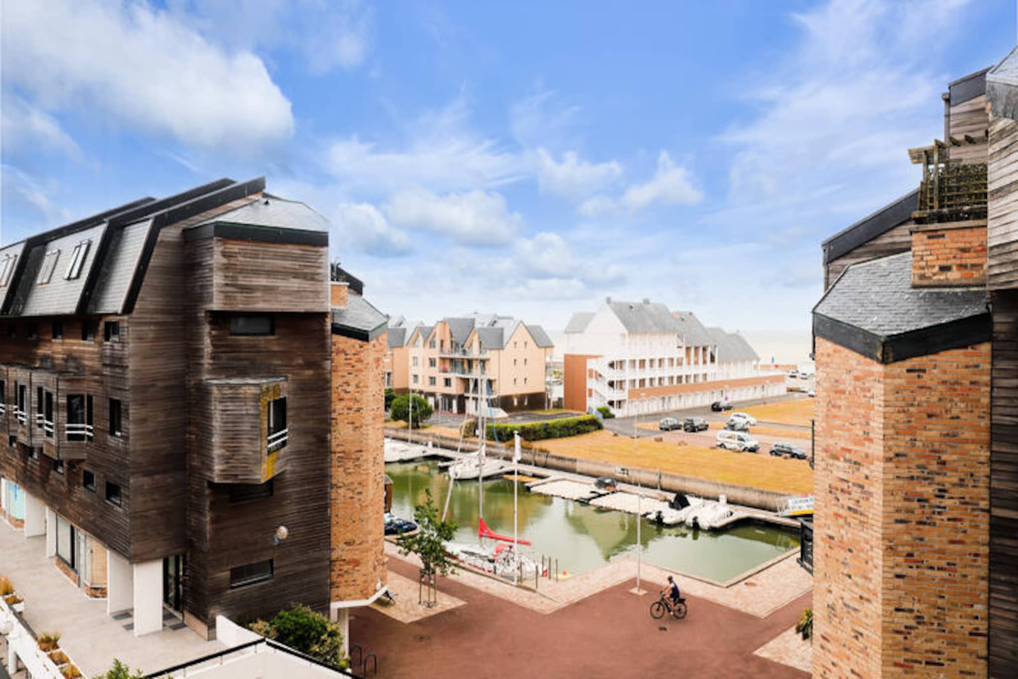 In the heart of the charming Port Deauville district, this cozy studio apartment offers a delightful retreat just a short stroll from the golden sands of Deauville Beach. Perched on the 5th floor of the 'Les Marina' residence, the property combines convenience with comfort, making it an ideal choice for couples or solo travelers seeking a seaside escape. From your private balcony, enjoy serene views and the refreshing coastal breeze, setting the tone for a relaxing getaway. 
 
 The 25 m² studio is thoughtfully designed with a sofa bed, a dining area for four, and a fully equipped open-plan kitchen, ensuring all the essentials for a comfortable stay. The bathroom features a bathtub, and there is a separate toilet for added convenience. Modern amenities such as free Wi-Fi, a washing machine, and access to public parking enhance your experience, while the residence itself offers an elevator and bicycle storage for ease of use. 
 
 Step outside and find yourself just 500 meters from the beach, perfect for sunbathing or leisurely seaside walks. The vibrant town center, with its array of shops and restaurants, is only 800 meters away, while the renowned Deauville International Centre and the Deauville-La Touques Racecourse are within easy reach. For those seeking relaxation, the Deauville thermal center and indoor swimming pool are just over a kilometer away. Golf enthusiasts will appreciate the nearby course, and the bus stop and railway station ensure seamless connectivity to explore the region. 
 
 Whether you're drawn to the allure of Deauville's glamorous events, its historic landmarks, or simply the tranquility of its beaches, this studio offers a perfect base to experience it all. Let the charm of Normandy captivate you as you unwind in this inviting coastal haven.