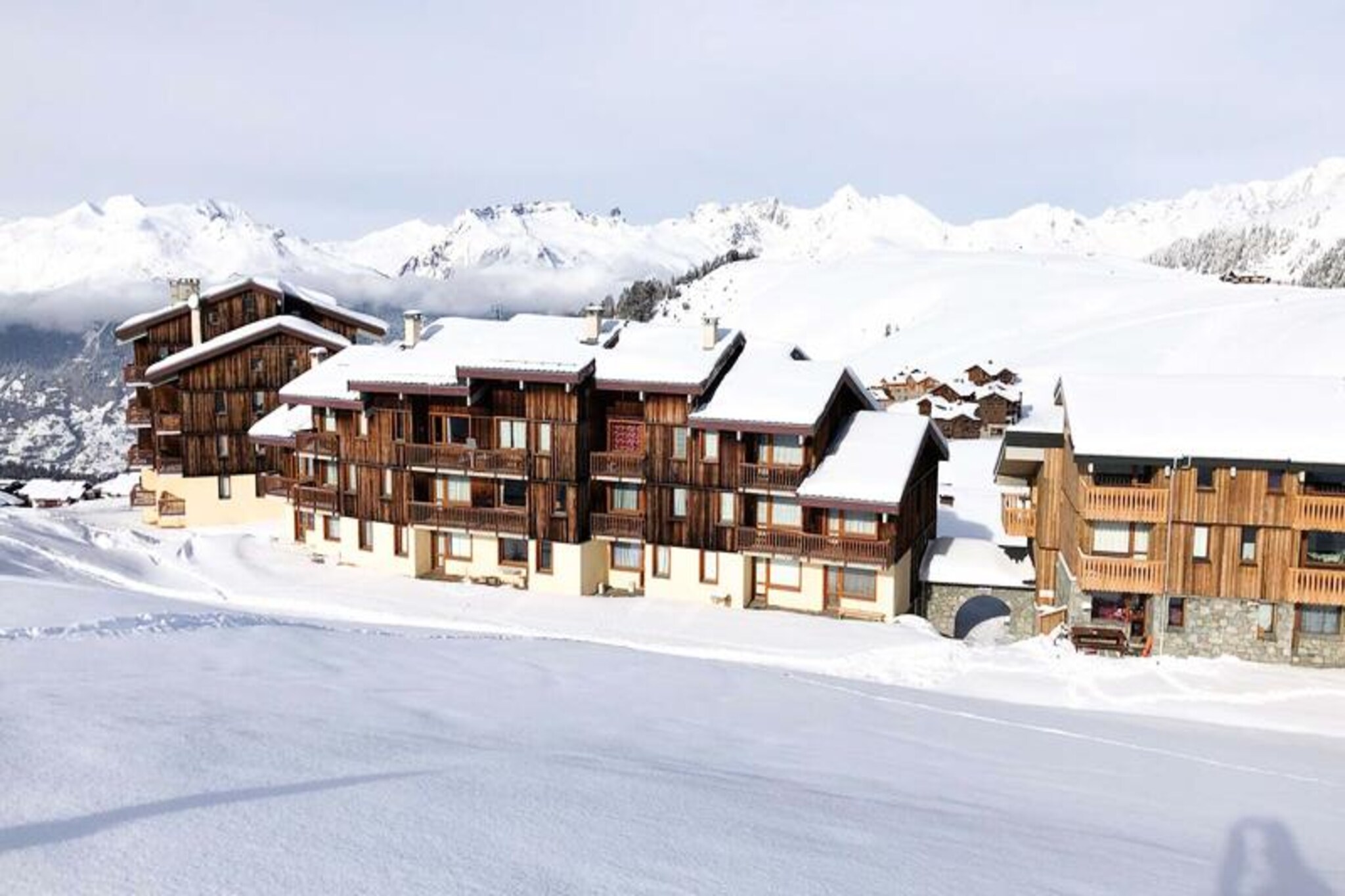 High above the serene slopes of Plagne Villages, this charming studio apartment invites you to experience the magic of the Paradiski domain. From its south-facing position, you’ll wake up to breathtaking views of the snowy pistes, ready to step directly onto the slopes for a day of alpine adventure. Whether you're here for skiing in winter or hiking in summer, this cozy retreat offers a perfect blend of comfort and convenience, making it an ideal choice for couples or small families seeking an unforgettable mountain escape. \n\nInside, the 26m² studio is thoughtfully designed to maximize space and functionality. The divisible living area features a double sofa bed, two pull-out beds, and a single sofa bed, ensuring flexible sleeping arrangements for up to five guests. The separate kitchen is fully equipped with modern amenities, including induction hobs, a combi oven, refrigerator, dishwasher, and electric coffee maker, making it easy to prepare hearty meals after a day on the slopes. With a bathtub for relaxing soaks, a separate toilet, and included WiFi, every detail has been considered for your comfort. \n\nSituated in a quiet three-story residence at the foot of the slopes, the apartment offers direct ski access (snow removal not guaranteed) and is just 700 meters from local shops, accessible via a free shuttle service every 15 minutes. Free outdoor parking near the residence adds to the convenience, while the nearby gondola connects Plagne Villages to Plagne Centre, opening up even more opportunities for exploration. \n\nWhether you're drawn to the thrill of skiing, the charm of alpine villages, or the tranquility of mountain landscapes, this studio is your gateway to the best of the French Alps. Create lasting memories in this idyllic setting, where every moment feels like a postcard come to life.