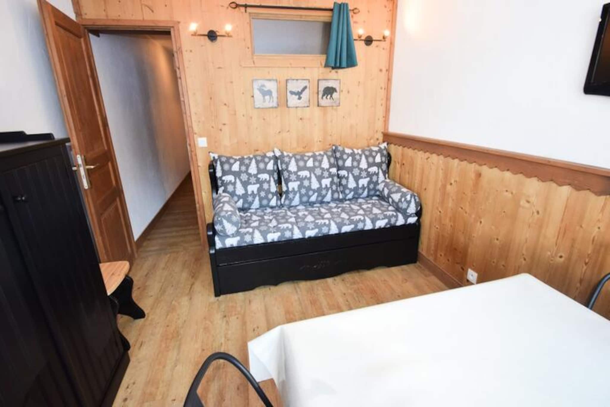 Imagine waking up to the sight of pristine slopes and the majestic Alps stretching out before you. This charming studio apartment, located in the heart of Plagne Centre, offers a cozy retreat for up to four guests. With its south-facing balcony, you can soak in the stunning views of the mountains and ski slopes, making it the perfect base for your alpine adventures. Whether you're here to carve through the snow or simply relax in the serene mountain atmosphere, this residence promises an unforgettable stay. \n\nStep inside and discover a thoughtfully designed space featuring modern amenities for your comfort. The studio includes a fully equipped kitchen with induction hobs, a refrigerator, a combi oven, and a dishwasher, ensuring you have everything you need to prepare delicious meals after a day on the slopes. The living area boasts two trundle beds, a dining space, and a TV, while a separate sleeping alcove with bunk beds provides additional privacy. The bright and renovated interior creates a warm and inviting ambiance, complemented by a well-appointed bathroom with a shower and toilet. \n\nConveniently situated on the 4th floor with elevator access, the apartment also includes a ski locker for easy storage of your gear. Plagne Centre offers a vibrant array of shops, restaurants, and après-ski activities, all within walking distance. For ski enthusiasts, the slopes are just steps away, providing seamless access to the renowned Paradiski domain. In summer, the area transforms into a haven for hikers and nature lovers, with trails that reveal the breathtaking beauty of the Alps. \n\nWhether you're seeking thrilling winter sports or tranquil summer escapes, this studio is your gateway to the best of the French Alps. Book your stay now and create memories that will last a lifetime.