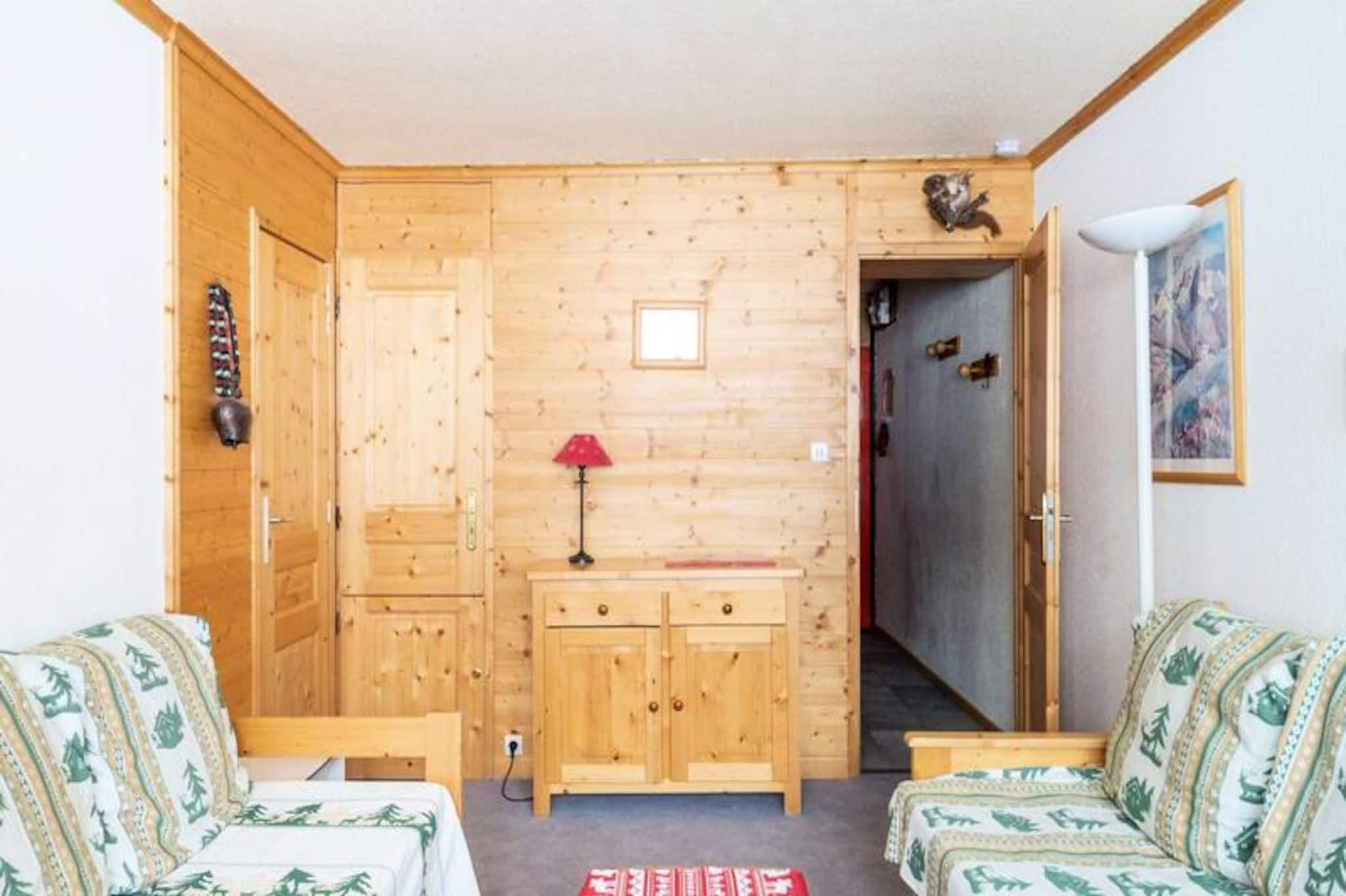 High above the snow-dusted peaks of La Plagne, this charming studio invites you to embrace the magic of the French Alps. With its south-facing balcony offering uninterrupted views of the slopes, every moment here feels like a postcard come to life. Whether you're sipping your morning coffee or unwinding after a day of alpine adventures, the warmth of the sun and the beauty of the mountains create an atmosphere of pure serenity. Perfectly situated on the 5th floor with elevator access, this cozy retreat is ideal for couples seeking a romantic getaway or solo travelers yearning for tranquility. \n\nInside, the studio is thoughtfully designed to maximize comfort and convenience. The well-equipped kitchen features two electric hotplates, a microwave, dishwasher, and coffee makers, ensuring you have everything needed to prepare hearty meals or quick snacks. The living area boasts a comfortable double sofa bed, a dining space, and a TV, making it a welcoming spot to relax after skiing or exploring the nearby trails. The bathroom includes a bathtub and toilet, while the ski locker on the ground floor ensures your gear is always ready for action. \n\nStep outside, and you'll find yourself at the foot of the slopes, with easy access to the ski lifts and a gallery connecting you to shops, restaurants, and après-ski delights. Plagne Centre is a hub of activity, offering everything from equipment rentals to cozy cafes where you can savor local specialties. In summer, the area transforms into a haven for hikers and cyclists, with trails weaving through breathtaking alpine landscapes. \n\nWhether you're here for the thrill of skiing or the peace of mountain air, this studio offers an unforgettable escape in one of France's most iconic destinations. Let the charm of La Plagne and the comforts of this residence make your holiday truly special.