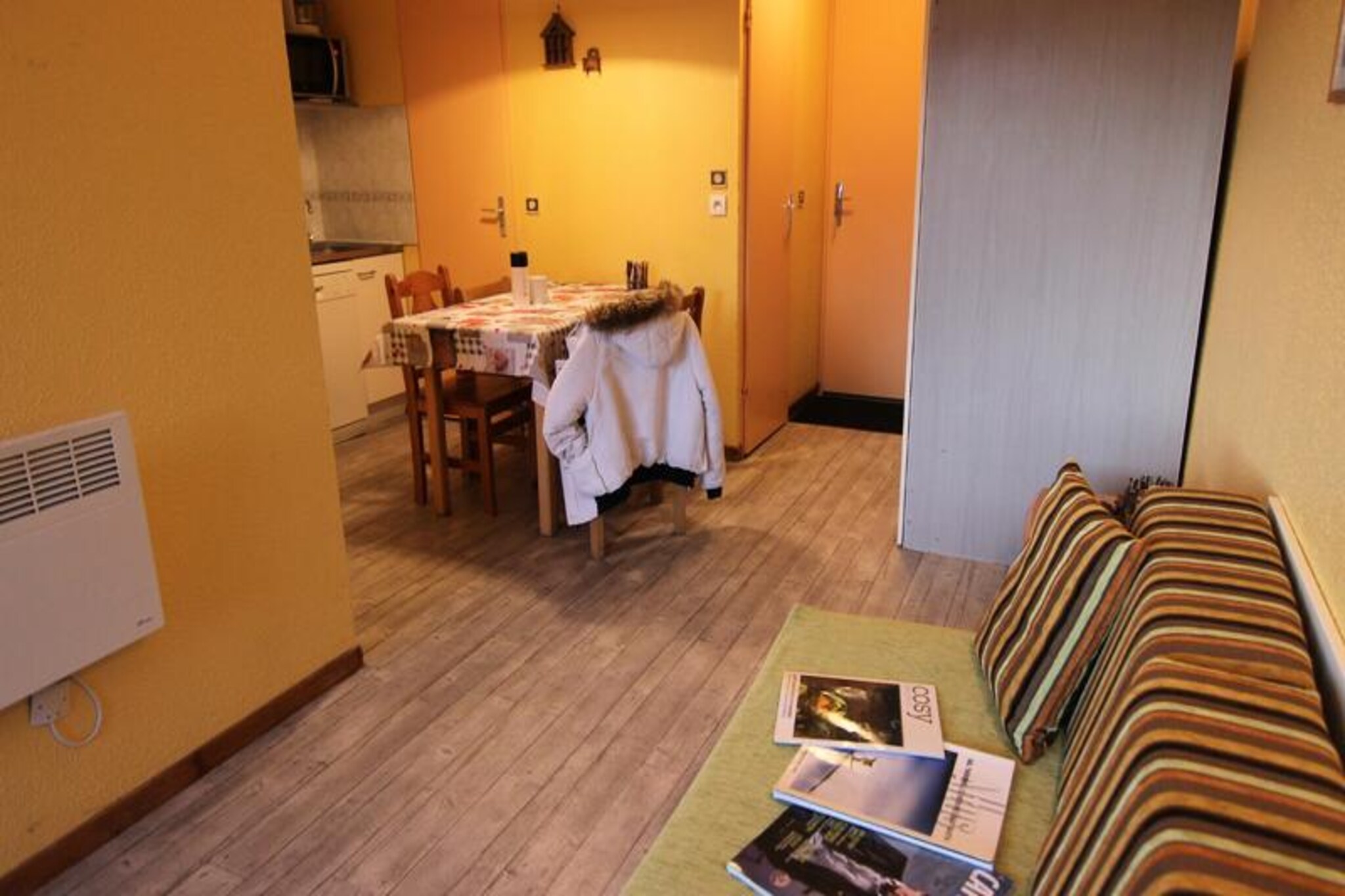 At the gateway to the vibrant Arolles district, this cozy apartment in the Altineige residence offers a perfect retreat for those seeking both adventure and convenience. With its prime location near the resort entrance, you'll be steps away from the lively energy of Val Thorens, surrounded by restaurants, bars, shops, and the Caron shopping and sports center. Whether you're here for the slopes or the après-ski, this property places you right in the heart of it all. \n\nThe 25m² apartment, located on the 4th floor with elevator access, is thoughtfully designed to accommodate up to four guests. The living room features a pull-out sofa bed that transforms into two single beds, while a separate bedroom with twin beds ensures privacy and comfort. A well-equipped kitchenette with a microwave/grill, electric stovetop, refrigerator, and dishwasher makes it easy to prepare meals after a day of alpine adventures. The southwest-facing balcony invites you to unwind with stunning views as the sun sets over the mountains. Modern amenities like a TV and a separate bathroom and toilet add to the convenience of your stay.\n\nJust a stone's throw from the slopes, you'll have effortless access to some of the best skiing in the world. The nearby SKISET sports shop on the ground floor ensures you're always ready for the next run. Beyond skiing, the Arolles district offers a dynamic atmosphere with its bustling nightlife, local eateries, and essential services like a mini-market and bus station right across the street. \n\nWhether you're a seasoned skier or simply looking to soak in the charm of the French Alps, this apartment provides the perfect base for an unforgettable mountain escape. Let the magic of Val Thorens captivate you as you create memories to last a lifetime.