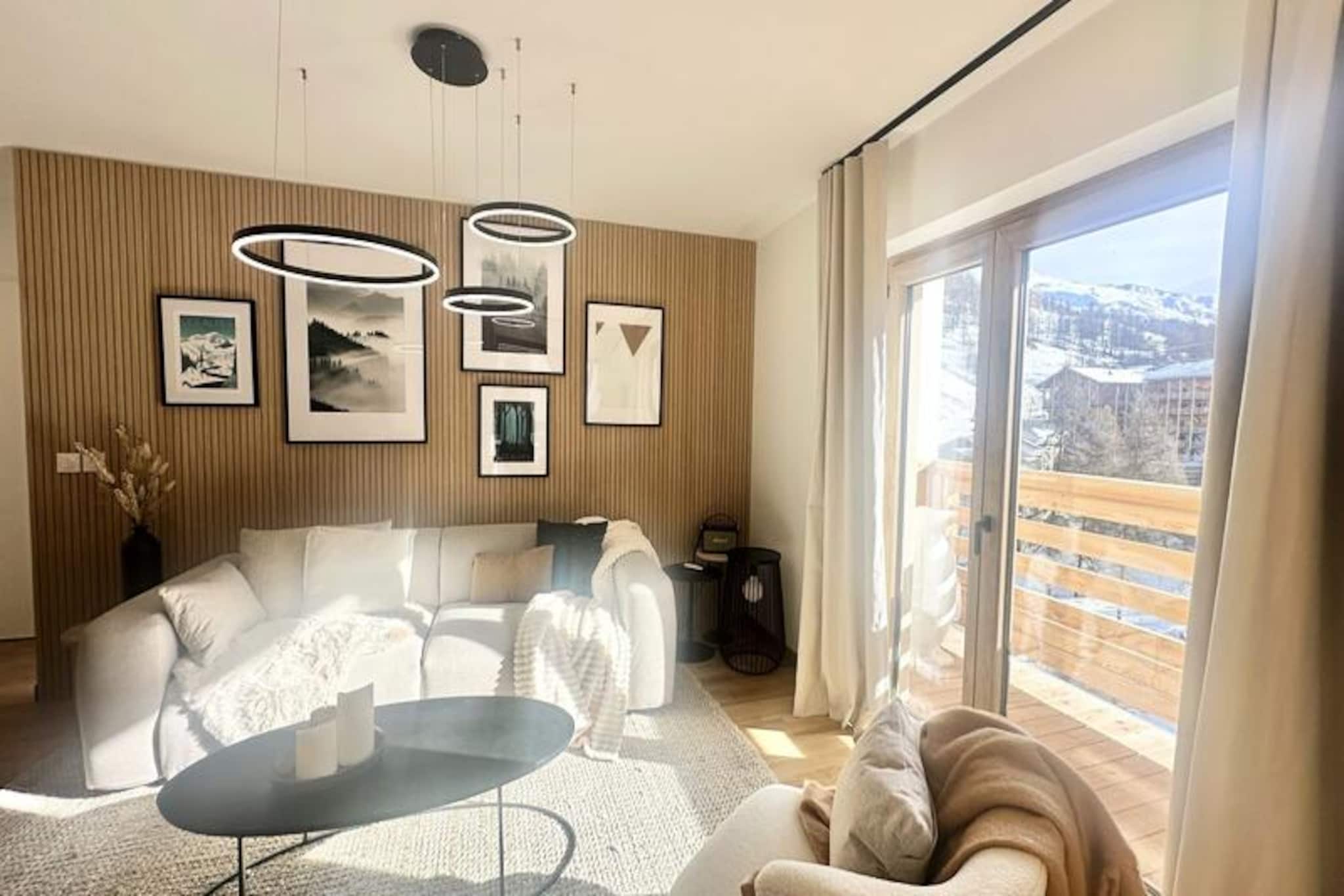 In the vibrant heart of Vars Les Claux resort, this modern apartment offers a serene mountain retreat just steps from the slopes and local amenities. Imagine waking up to the crisp alpine air, enjoying breakfast on your southeast-facing terrace, and heading out to explore the snowy landscapes or charming village streets. With its prime location just 200 meters from the snow front, this residence is perfect for those seeking convenience and comfort in the French Alps. Whether you're here for skiing, hiking, or simply relaxing, this cozy apartment sets the stage for unforgettable moments. \n\nDesigned for up to four guests, the apartment boasts a thoughtfully arranged layout with two beautifully decorated bedrooms. The master bedroom features a double bed and a walk-in closet, while the second bedroom offers two single beds that can be combined, along with a practical office space for remote work. The spacious living area is ideal for unwinding after a day of adventure, complete with a fully equipped kitchen featuring modern appliances like a Nespresso coffee machine, combi oven, and dishwasher. A comfortable sofa, dining table, and television create a welcoming atmosphere for evenings spent indoors. \n\nThe residence also provides private covered parking, ensuring ease of access throughout your stay. For added convenience, the local Vars agency offers ski pass sales and equipment rentals, making it effortless to hit the slopes. While end-of-stay cleaning and linens are optional, they can be arranged through the agency for a hassle-free experience. \n\nDiscover the charm of Vars Les Claux, where alpine beauty meets modern comfort. Whether you're savoring sunny lunches on the terrace or exploring the nearby trails, this apartment is your gateway to an unforgettable mountain escape. Please note that pets are not allowed, and the apartment is non-smoking. Nearby construction work is ongoing, but the tranquility of the mountains remains undisturbed.