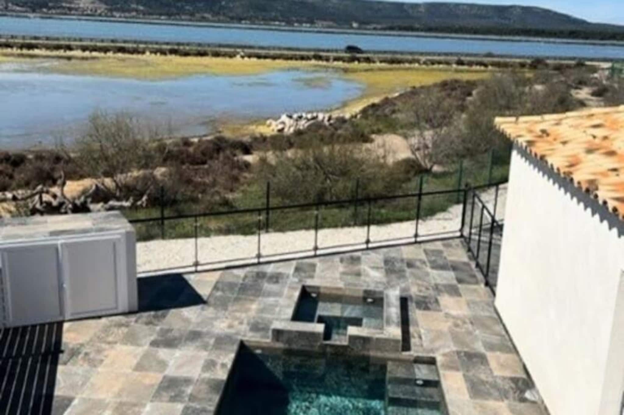 Imagine waking up to the gentle sound of waves and the scent of the sea breeze in this stunning contemporary villa, just 100 meters from the beach. Nestled between the shimmering Mediterranean Sea and a tranquil pond, this family-friendly retreat offers a perfect blend of luxury and nature. Whether you're soaking in the jacuzzi as the sun sets or enjoying a refreshing dip in the southwest-facing pool, every moment here is designed to create unforgettable memories. The villa’s modern design and serene surroundings make it a true haven for relaxation. 
 
 Inside, the villa boasts a spacious master suite complete with an upstairs terrace, offering breathtaking views of the surrounding landscape. A dedicated children’s area ensures that younger guests have their own space to play and unwind. The open-plan living area is bathed in natural light, seamlessly connecting to the outdoor spaces. With high-end amenities and thoughtful touches throughout, this property is ideal for families or groups seeking comfort and style.
 
 Step outside and you’ll find yourself in a paradise of possibilities. The pristine beach is just a short stroll away, inviting you to spend your days swimming, sunbathing, or exploring the coastline. The nearby pond offers a peaceful setting for nature walks or birdwatching. Local markets, charming seaside restaurants, and cultural landmarks are all within easy reach, allowing you to immerse yourself in the vibrant spirit of the region.
 
 Whether you’re seeking a tranquil escape or an active seaside adventure, this villa provides the perfect base. With its unbeatable location, luxurious amenities, and enchanting atmosphere, it’s a place where cherished memories are made. Please note that noisy evenings are not permitted, ensuring a peaceful environment for all guests.