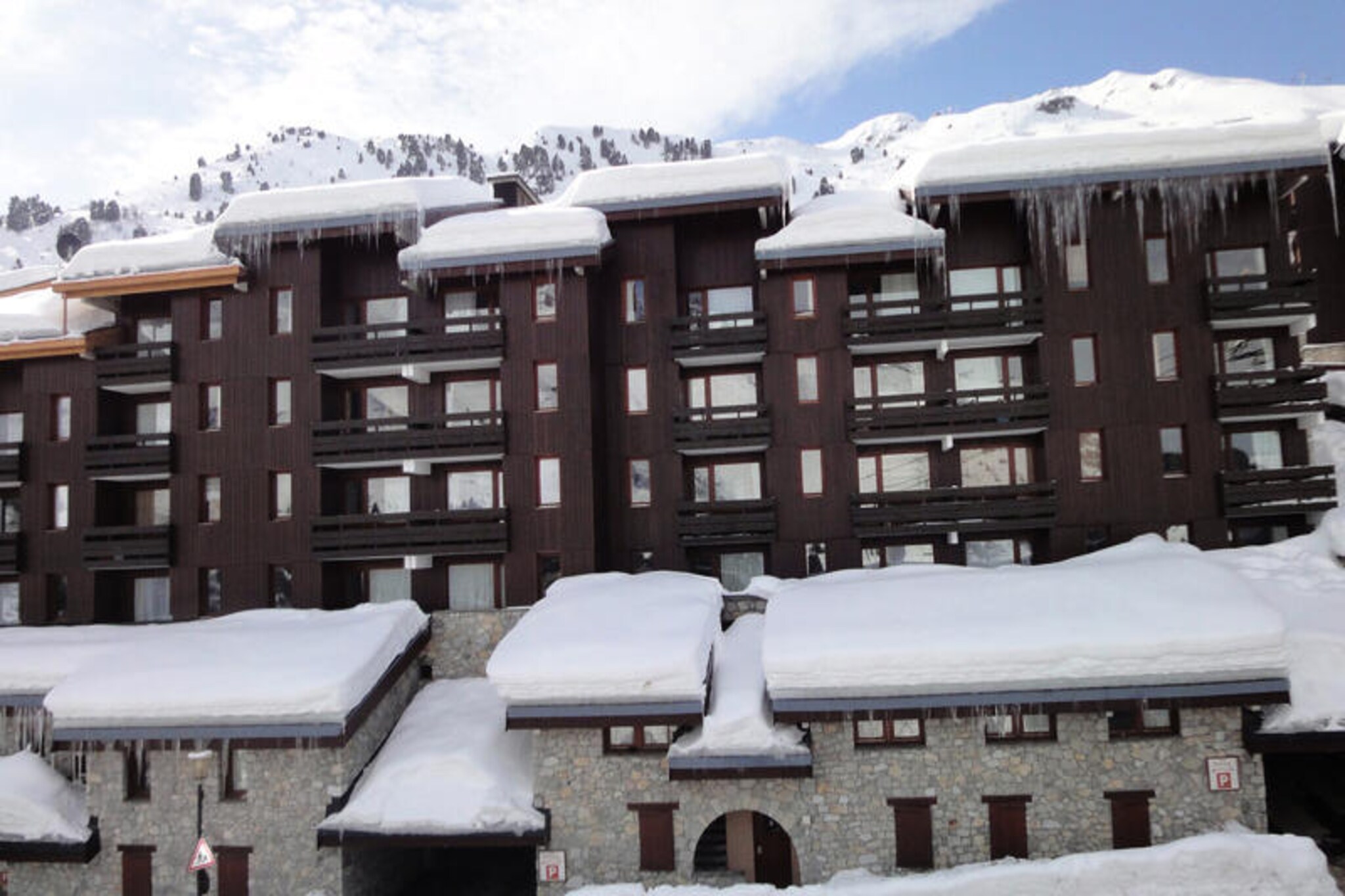 In the heart of the charming Hameau district of Le Laitelet, this cozy alpine retreat offers a perfect blend of convenience and comfort for your mountain getaway. Imagine stepping out of your door, crossing the square, and putting on your skis at the edge of the Perdrix green slope, ready to explore the pristine trails of the surrounding area. With the Chalets cable car providing free access from early morning to late evening, you’re perfectly connected to the vibrant energy of the slopes and nearby amenities. \n\nThis thoughtfully designed apartment is ideal for up to four guests, featuring a west-facing balcony that invites you to relax and soak in the serene mountain views. The living area includes a comfortable double sofa bed, while the bedroom, separated by a sliding wall, offers a cozy double bed for restful nights. A well-equipped kitchenette with modern appliances makes it easy to prepare meals, and the flat-screen TV ensures entertainment after a day of adventure. The apartment is pet-friendly, non-smoking, and comes with a secure deposit for peace of mind.\n\nBeyond the residence, you’ll find yourself immersed in the beauty of the French Alps. The nearby shops and restaurants in the Hameau district provide everything you need for a convenient stay, while the slopes beckon for skiing enthusiasts of all levels. Whether you’re here to carve through the snow or simply unwind in the crisp alpine air, this property offers an unforgettable escape. Make your next holiday one to remember in this delightful mountain haven.