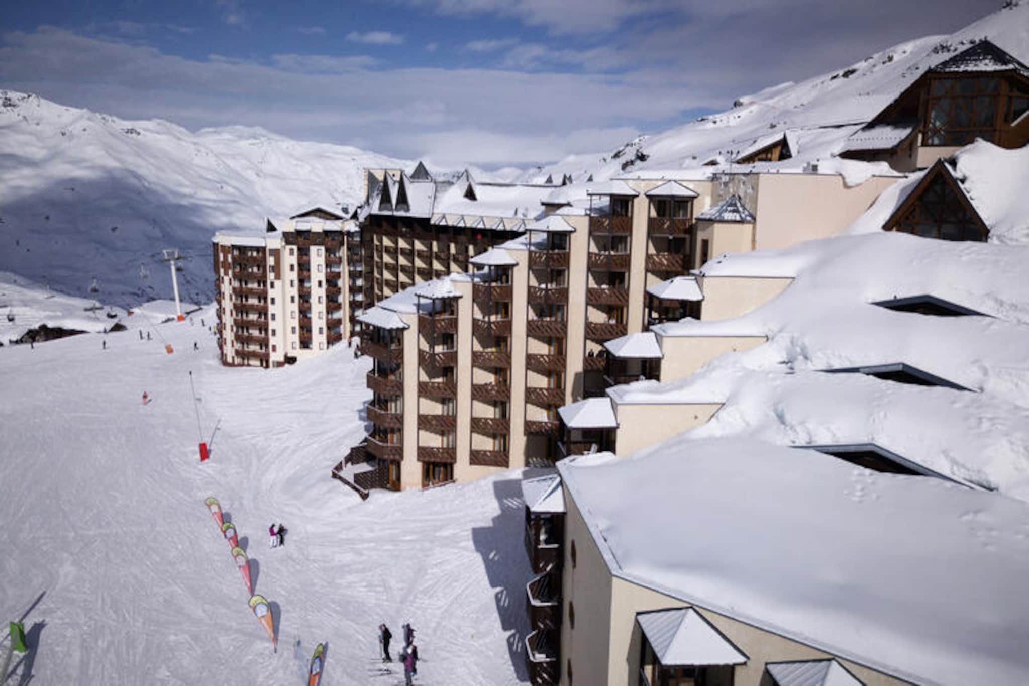 In the heart of the Soleil-Machüu district, where the charm of alpine living meets modern convenience, this cozy two-room apartment offers a perfect retreat for your mountain getaway. Located within the renowned Les Temples du Soleil residence, it provides direct access to the slopes, making it an ideal choice for ski enthusiasts looking to maximize their time on the snow. Imagine stepping out of your ski locker and gliding straight onto the pristine runs of the resort, all while soaking in the breathtaking views of the surrounding peaks.
This thoughtfully designed apartment, situated on the 3rd and 4th floors of the residence, comfortably accommodates up to four guests. The living room features a plush sofa bed and a television, creating a welcoming space to unwind after a day of adventure. The bedroom, with two single beds, ensures a restful night’s sleep. A well-equipped kitchenette with an oven, microwave, large refrigerator, electric stovetop, and dishwasher allows you to prepare hearty meals to enjoy on the south-facing balcony, where the sunlit slopes create a stunning backdrop. The bathroom includes a bathtub and sink, while a separate toilet adds convenience.
Les Temples du Soleil offers a range of on-site amenities, including a games room, restaurant, bar, sports shop, and mini-market, ensuring that everything you need is within reach. For those seeking relaxation, the residence features a fitness room, jacuzzi, sauna, and steam room, available for a fee. The vibrant Soleil-Machüu district is also a hub of activity, with its lively après-ski scene and easy access to the resort’s attractions.
Whether you’re here to carve through the snow, explore the alpine trails, or simply soak in the serene mountain atmosphere, this apartment is your gateway to an unforgettable holiday experience in the French Alps.