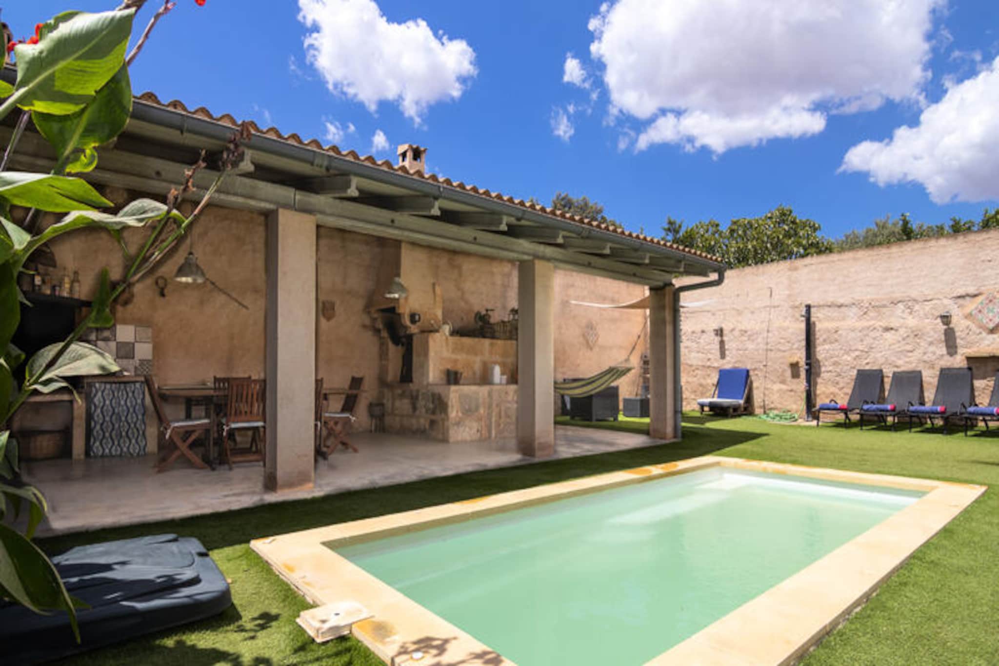 In the heart of the serene Mallorcan countryside, this charming villa in Ariany invites you to experience the perfect blend of comfort and tranquility. Surrounded by golden fields and picturesque landscapes, this property offers a peaceful retreat for families or small groups seeking a relaxing getaway on the island. Wake up to the gentle sounds of nature and enjoy the warm Mediterranean sun from your private terrace. \n\nSpanning 160 m², the villa comfortably accommodates up to four guests with its three cozy bedrooms and two bathrooms. The living room and two of the bedrooms are equipped with air conditioning to keep you cool during the summer months, while the two fireplaces, located in the living room and kitchen, provide a cozy ambiance for cooler evenings. The fully equipped kitchen, featuring modern appliances such as a refrigerator, oven, microwave, dishwasher, and more, makes preparing meals a delight. For entertainment, the villa offers satellite TV with multilingual channels and fast, free internet access. \n\nStep outside to discover a beautifully maintained outdoor space. The private pool is perfect for refreshing dips on sunny days, while the large terrace with a barbecue invites you to enjoy al fresco dining with loved ones. The fully fenced plot ensures privacy and security, and there’s secure parking available on-site for your convenience. \n\nLocated in the peaceful village of Ariany, this villa is an ideal base for exploring the authentic charm of Mallorca. Wander through the quaint streets, immerse yourself in local culture, or venture out to nearby historical attractions. Whether you’re seeking relaxation or adventure, this property offers the perfect starting point for an unforgettable Mallorcan experience.