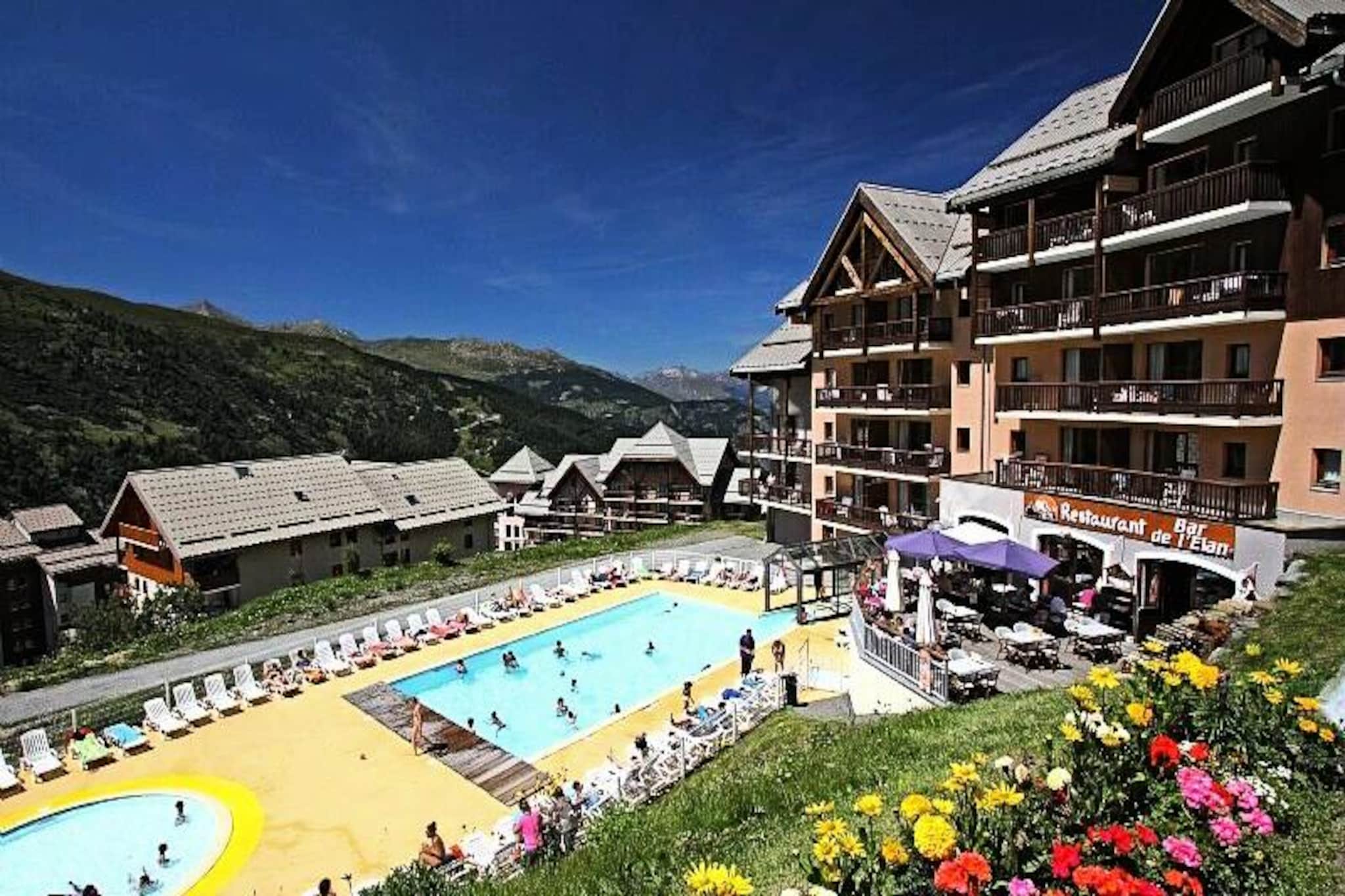 High above the Maurienne valley, where the Northern and Southern Alps converge, Résidence Le Thabor offers an alpine retreat that perfectly blends adventure and relaxation. With its prime location in the heart of Valmeinier 1800, this family-friendly residence places you directly at the foot of the slopes, making it an ideal choice for ski enthusiasts of all levels. From the moment you arrive, you’ll be captivated by the breathtaking views of the snow-draped Thabor massif, a sight that sets the tone for an unforgettable mountain escape.
Inside, the 3-room apartment comfortably accommodates up to seven guests, providing a warm and inviting space to unwind after a day on the slopes. The layout includes a cozy living room, a fully equipped kitchen, two bedrooms, two bathrooms, and two toilets, ensuring both comfort and convenience. Guests will appreciate the thoughtful amenities, such as included bed linens and a maintenance kit, as well as the option to add services like Wi-Fi or daily housekeeping for a tailored experience. The residence also boasts a heated outdoor pool, offering a unique way to relax while soaking in the crisp alpine air.
Beyond the residence, Valmeinier 1800 is a lively and welcoming resort with activities for all ages. Whether you’re exploring the vast Le Galibier-Thabor ski area, indulging in local Savoyard cuisine, or simply enjoying the vibrant après-ski atmosphere, there’s something for everyone. In the summer months, the region transforms into a haven for hikers and nature lovers, with trails that wind through stunning alpine landscapes.
Whether you’re seeking thrilling outdoor adventures or a serene mountain retreat, Résidence Le Thabor promises a memorable stay in one of France’s most picturesque alpine destinations.
