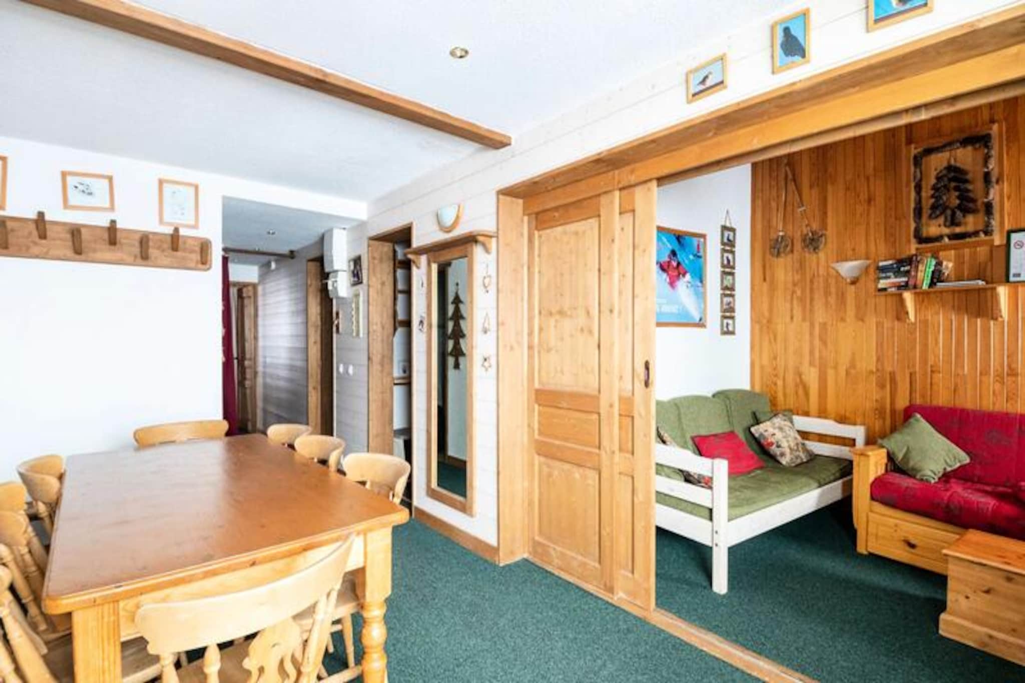 High above the charming slopes of Plagne Villages, this spacious duplex apartment invites you to experience the magic of the French Alps in every season. With its south-facing balcony offering panoramic views of the pistes, this mountain-style retreat combines comfort and convenience for families and groups of up to eight guests. Whether you're here for thrilling ski adventures or tranquil summer hikes, the residence is perfectly positioned to immerse you in alpine beauty. \n\nInside, the apartment boasts a thoughtful layout across two floors. The living room, cleverly divided by a sliding wall, features a cozy lounge area with pull-out beds and a dining space for shared meals. The separate kitchen is fully equipped with modern appliances, including an oven, microwave, refrigerator, and dishwasher, ensuring effortless meal preparation. Two bedrooms provide flexible sleeping arrangements, including a mezzanine ideal for children and bunk beds upstairs. With three bathrooms, each with a bathtub or shower and toilet, comfort is guaranteed for all guests. \n\nLocated at the foot of the slopes, the residence offers direct access to winter sports and is just 700 meters from shops, easily reachable via free shuttles running every 15 minutes. In summer, explore the breathtaking trails and outdoor activities that make Plagne Villages a haven for nature lovers. Free outdoor parking near the residence adds to the convenience, ensuring your stay is as seamless as possible. \n\nWhether you're seeking adrenaline-filled days on the slopes or peaceful evenings under the alpine stars, this apartment is your gateway to unforgettable mountain memories.