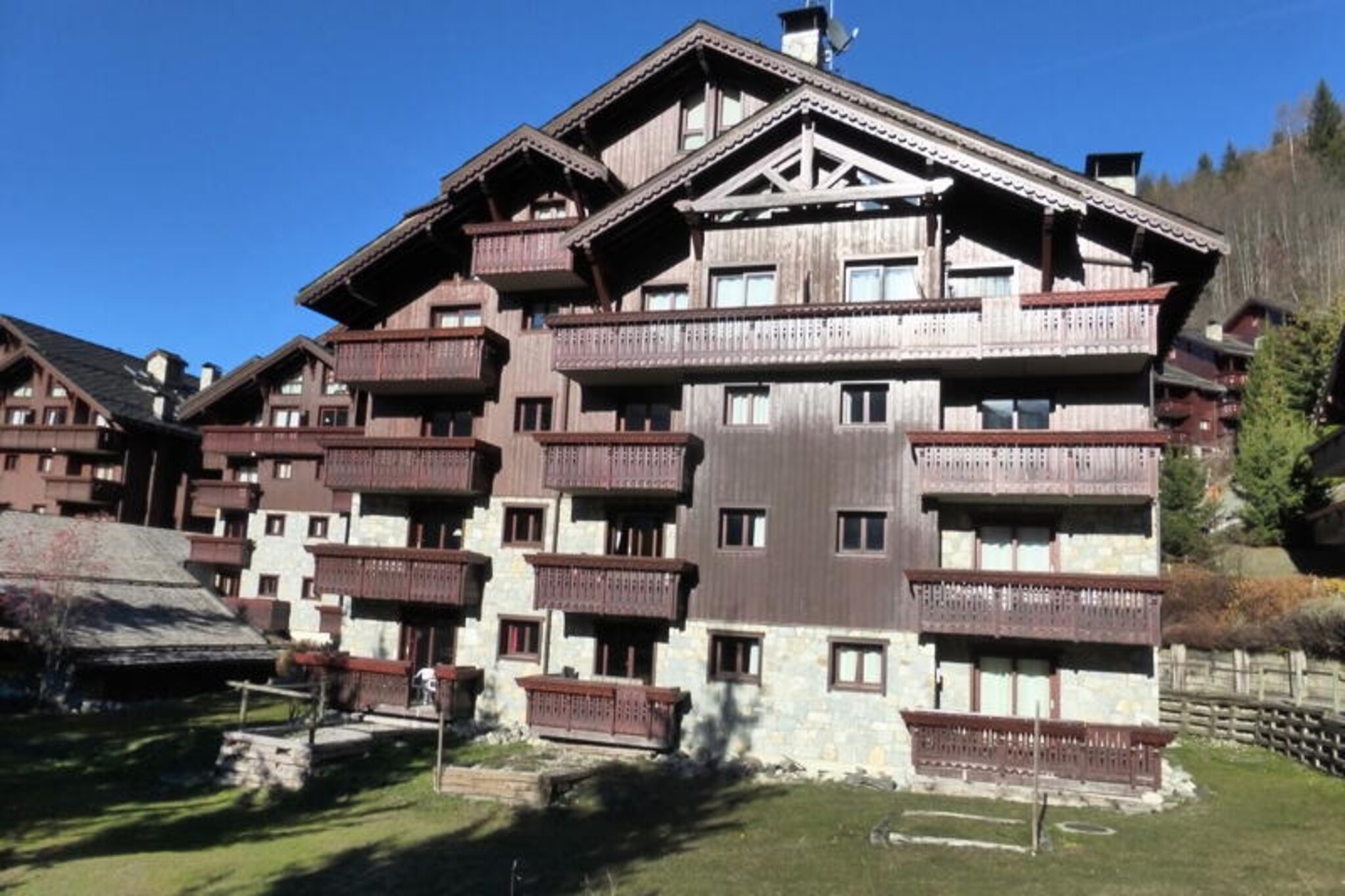 In the charming Méribel Village, where alpine tradition meets modern comfort, this delightful 2-bedroom apartment offers a serene retreat for your next mountain getaway. With its prime location at the foot of the slopes and just steps from the village shops, it’s the perfect base for both winter skiing adventures and summer alpine escapes. The free shuttle service conveniently connects you to the heart of Méribel, just 2 km away, ensuring you’re never far from the action while enjoying the tranquility of the village.
This cozy 38 m² apartment, awarded the prestigious Méribel 3* Label, is thoughtfully designed to accommodate up to 4 guests. The first bedroom features a comfortable double bed, a private television, a shower, and a sink, offering a touch of luxury and privacy. The second bedroom includes practical trundle beds, perfect for families or friends traveling together. The open-plan kitchen is fully equipped with ceramic hobs, an oven, a dishwasher, and a refrigerator, making it easy to prepare hearty meals after a day on the slopes. Relax in the inviting living area, complete with a television and DVD player, or step out onto the northwest-facing balcony to soak in the breathtaking mountain views.
Guests will also enjoy access to the residence's indoor swimming pool, located in building B, adding a touch of indulgence to your stay. A ski locker and a covered parking space ensure convenience, while the option to rent a Wi-Fi router keeps you connected. Nearby, the village offers a selection of shops and restaurants, and the slopes are just moments away, making this apartment an ideal choice for those seeking both adventure and relaxation.
Whether you’re carving through fresh powder in winter or exploring scenic hiking trails in summer, this Méribel Village apartment promises an unforgettable alpine experience. Book your stay today and immerse yourself in the beauty and charm of the French Alps.