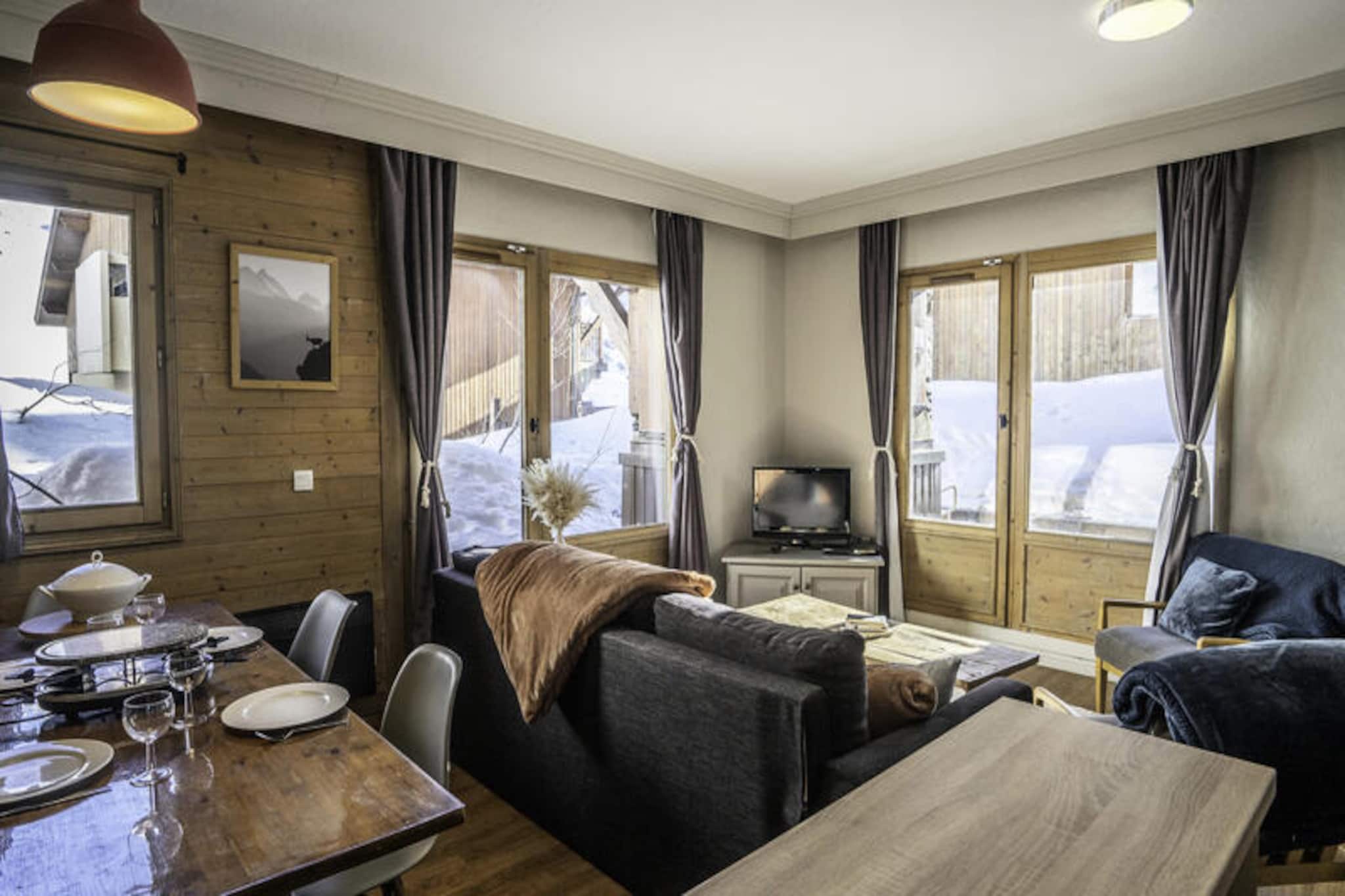 High above the shimmering slopes of Val Thorens, Chalet Alaska offers a serene retreat in the tranquil Balcons district, just a short 10-minute stroll from the lively heart of the resort. Here, panoramic views of the majestic mountains and the village below create a breathtaking backdrop for your alpine escape. Whether you're traveling with friends or family, this chalet provides the unique opportunity for everyone to enjoy their own private apartment, with options ranging from cozy two-bedroom spaces to expansive five-bedroom accommodations. Perfectly blending privacy and togetherness, Chalet Alaska ensures a tailored experience for all. \n\nThe three-room family apartment on the ground floor is thoughtfully designed for comfort and relaxation, accommodating up to six guests. Its south-facing terrace invites you to bask in the sun while enjoying the crisp mountain air. Inside, the living area is warm and inviting, with a pull-out sofa and a television for cozy evenings. The modern kitchen is equipped with everything you need to prepare delicious meals, including a ceramic hob, oven, microwave, dishwasher, and Nespresso coffee maker. The bedrooms are a haven of comfort, featuring a queen-size bed in the master room and twin beds in the second bedroom, ideal for children or friends. After a day on the slopes, unwind in the bathroom with its soothing bathtub and heated towel rail. \n\nChalet Alaska goes beyond expectations with its wellness amenities. Guests have access to a heated pool, sauna, and steam room, offering moments of pure relaxation. Ski-in/ski-out access makes hitting the slopes effortless, while the ski locker with boot dryers ensures optimal skiing conditions. A private parking space with an electric charging station adds convenience for those arriving by car. \n\nWhether you're here to carve through pristine snow or simply soak in the beauty of the Alps, Chalet Alaska promises an unforgettable stay where comfort meets adventure. Let the charm of Val Thorens and the warmth of this chalet create memories to last a lifetime.