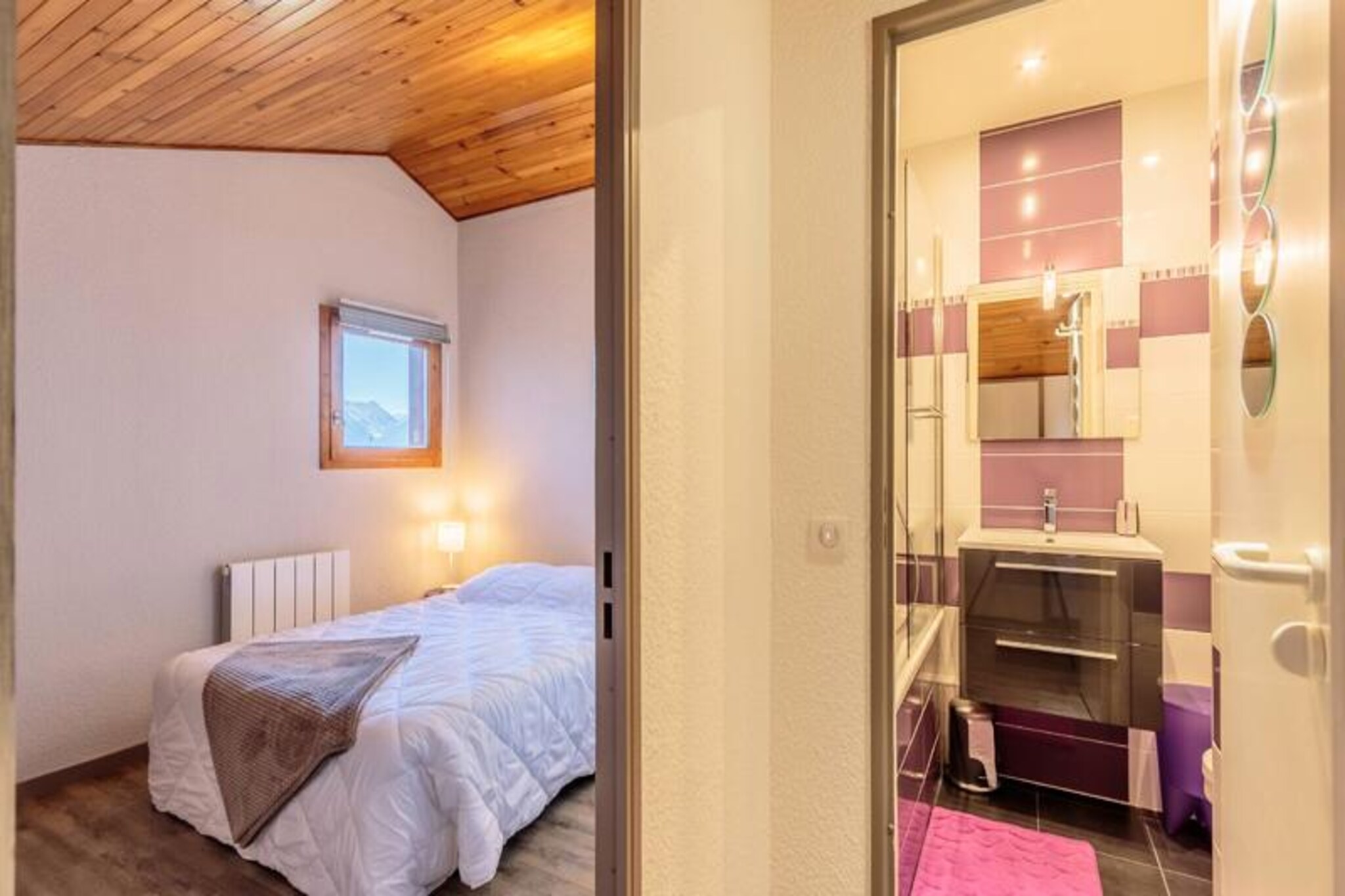 High above the charming alpine village of Montchavin, this cozy duplex apartment offers a serene retreat for up to five guests, blending modern comfort with traditional mountain charm. Located on the 4th floor of the Le 4ème Dé residence, this 38 m² space is perfect for families or small groups seeking a peaceful getaway amidst the breathtaking beauty of the French Alps. With its south-facing balcony, you can soak in uninterrupted views of the resort and surrounding peaks, making every morning a delight.
The apartment is thoughtfully designed to maximize comfort and convenience. Upstairs, you’ll find a tranquil bedroom with a double bed, a baby kit for young travelers, and a private TV. A bathroom with a toilet completes the upper level. Downstairs, the cabin area with bunk beds and a movable partition offers flexible sleeping arrangements, while the living room features a comfortable sofa bed and a second TV. The fully equipped kitchen includes a microwave, dishwasher, ceramic hobs, a refrigerator, and even a raclette set for cozy alpine evenings. Additional amenities such as a washing machine and two bathrooms ensure a hassle-free stay.
Situated just 200 meters from the slopes and 300 meters from the resort center, the residence offers the perfect balance of accessibility and tranquility. The traditional architecture of Le Hameau du Sauget, with its wood, stone, and slate design, creates a warm and inviting atmosphere. Whether you’re here to ski the pristine slopes of Paradiski or explore the forested trails in summer, this location places you at the heart of it all.
With its proximity to key facilities and activities, this apartment is ideal for those looking to immerse themselves in the alpine lifestyle. From the convenience of ski lockers to the charm of the nearby village, every detail has been considered to make your stay unforgettable. Experience the magic of the French Alps in this delightful mountain retreat.